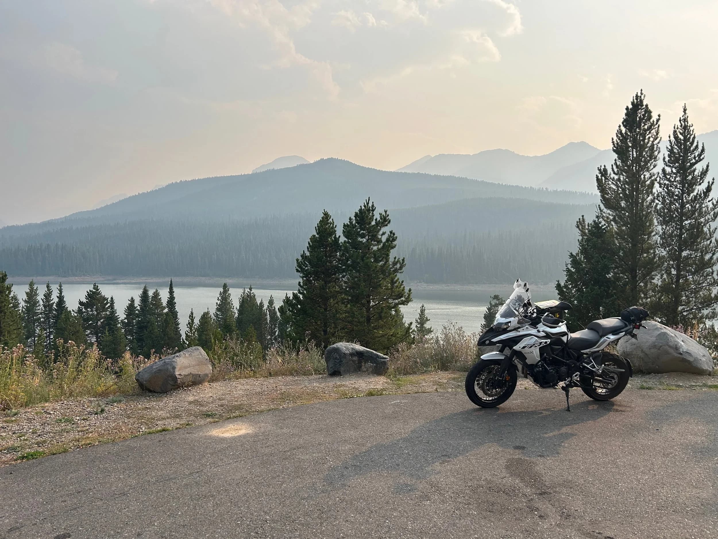 Trip Report: NW National Parks Loop
I left my job recently to take a much needed sabbatical and figure out what I’m doing next. A few weeks after my last day at work I embarked on what was to be a three week tour of NW-ish National Parks from Portland, to include Olympic, North Cascades, Glacier, Yellowstone, Grand Teton, Craters of the Moon, Lassen Volcanic, and Crater Lake.
I ended up missing Grand Tetons due to weather and I had to cut the trip short before I got to Lassen (family medical issue), so Lassen and Crater Lake remain unvisited.
Trip Dates: Sept 3 - Sept 16 (13 days)
Total Travel Miles: 3478 (does not include local miles for store runs, etc.)
Total Gallons of Gas Used: 82
Equipment: 2021 Benelli TRK502X Gaia GPS & Google Maps running on Sonim XP8 rugged Android phoneButler Motorcycle Maps (paper maps of best M/C roads in the country) iPhone 14 (main camera) Akaso Brave 7 helmet-mounted adventure camera Spot X satellite communicator and tracker Wolfman Luggage WP waterproof tank bag and saddle bags (no longer available) Watershed Colorado dry bag duffel (across the pillion seat) Kriega US-5 Drypack (tail bag) Kriega 3L hydration backpack (strapped to duffel, not worn)Marmot Ajax 2 tent Nemo hydrophobic down sleeping bag (non-mummy)Helinox ultralight cot MSR WhisperLite International stove
(Purchased in 1991 for my first moto trip: Detroit, MI to San Diego and back on an XT250)Gossamer Gear Bare Boxer bear-proof food canisters (two - one in each saddle bag)
Day 1 - Olympic National Park Date: Tuesday 9/3/2024
Destination: South Beach Campground, Olympic National Park
Travel Time: 4h 24m
Miles: 213Notes:
Planned to head west to Astoria then north from there, but left later than expected so headed up I-5 to US 12. I’ve driven/ridden that stretch of I-5 hundreds of times (starting in 1993). It’s boring and I hate it.
South Beach CG is first-come-first-served. I didn’t have issue getting a site. There is a long, tight loop of sites along the coastline, but I chose one of the sites further back near the bathrooms due to wind concerns. The bathroom building provided a sort of wind shelter for my site.
I used the heated grips on this leg; it was pretty chilly along the coast in the Olympic Peninsula. I almost didn’t install them, thinking I was being paranoid about the cold. I ended up using them a lot.
Day 2 - Ferry to Seattle / Burien Date: Wednesday 9/4/2024
Destination: Friend’s house in Burien, WA
Travel Time: 7h 30m
Miles: 199
Notes:
Slept well (thanks to Advil PM). I’ve not been sleeping well for more than a year. I’m really hoping to reset my sleep patterns with this trip. A good night’s sleep is one of my great joys and I feel like I’ve been robbed of that pleasure.
Used my Aeropress this morning for the first time ever. I’m hooked.
Headed up along US 101 through Port Angeles and then down to the Southworth ferry terminal near Port Orchard. Ferried across to Fauntleroy, which is just a few miles north my friend’s house in Burien. I’m always surprised at how long it takes to get from the Olympic Peninsula to the east side of Puget Sound (Seattle, etc.). With the ferry crossing (I love ferries) it took seven and a half hours to go 200 miles.
Discovered at my first stop of the day (just up 101 at the Kalaloch Campground, stopped to refill water) that the battery is quite weak and won’t start the bike if you leave the ignition on for even two minutes without the motor running. This would become a theme for the next few days. Fortunately, I have a jumper box and a permanent jump harness wired to the battery so jump starts are a quick operation.
Had a good evening with old friends.
Day 3 - North Cascades via Mountain Loop RoadDate: Thursday 9/5/2024
Destination: Newhalem Campground, North Cascades National Park
Travel Time: 4h 30m
Miles: 146Notes:
Slept well, on the couch. No pills needed.
I realized yesterday that my summer riding gloves (Rev’It Dune) were a size (or two) too small. Rev’It gloves fit really tight and I feel like I can never get it quite right. And yet, I love them. So, I stopped at a Cycle Gear in Bellevue to pick up something summer weight (Dirt 3) that fit better. They’re better, but maybe still one size too small. Such is life.
From Bellevue, I rode north and took the Mountain Loop Hwy then on up north to North Cascades. It was a hot ride. Still summer.
A small section of the Mountain Loop Road is dirt/gravel, which I didn’t realize. No biggie. Was just surprised (clearly I didn’t study my maps closely enough). When riding solo on a bike that weighs over 500 lbs., I tend to avoid planning much off-pavement riding. That’s what my DR-Z is for.
Day 4 - Newport, Washington via Winthrop Date: Friday 9/6/2024
Destination: Golden Spur Motor Inn, Newport, Washington
Travel Time: 8h
Miles: 308
Notes:
Slept just ok, even with Advil PM.
Pretty ride through North Cascades National Park and Colville National Forest. Didn’t do any backroads or hikes. Discovered (new to me) the town of Winthrop. Stopped for coffee at Sheri’s and resupplied on freeze-dried food at Cascades Outdoor Store.
The town of Newport is almost nothing, but, inexplicably, there’s an amazing restaurant (Brownell’s Place). Had dinner and a few ciders. Met and chatted with the owner/chef (she’s great). Listened to some live music. Then back to the motel.
Day 5 - New Battery in Kalispell Date: Saturday 9/7/2024
Destination: West Glacier KOA, West Glacier, MT
Travel Time: 8h 7m
Miles: 293
Notes:
Slept well on motel bed (on sleeping bag, not in the sheets). Another hot one.
Discovered that the water pump seal leaks oil. A quick post in the TRK Facebook group revealed that this is a common problem on this bike, and and easy fix. It’s apparently just a bad o-ring.
Battery has been getting continuously worse, and now requires I jump start the bike about every other start. Google Maps to the rescue: directions to the Batteries Plus in Kalispell, please. They don’t have an Odyssey AGM in the right size; the Duracell will have to do. (It’s been great.)
I set up camp at the West Glacier KOA, which will be my base for a few days. KOAs are their own little world. Very strange. Not really my thing, but the on-site laundry was handy.
After setting up camp I opened a cider and used the iPad to book a vehicle reservation for the next day to ride Going to the Sun Road, which I really wanted to do.
Day 6 - Going to the Sun RoadDate: Sunday 9/8/2024
Destination: Local Ride: West Glacier, Going to the Sun Road, Saint Mary, East Glacier
Travel Time: 5h 35m
Miles: 142Notes:
Quick breakfast and gas up in West Glacier before entering Going to the Sun Road.
Going to the Sun Road was stunning. This was the first point in the trip where I had tingles and was giddy at what I was seeing.
Took a very short hike along Saint Mary Lake. Again, I was beside myself with the beauty.
Lunch at the general store in Kiowa.
The rest of the ride back after East Glacier was meh, but I just kept thinking about how amazing what I’d seen in the morning had been.
Dinner at the KOA. Tacos from a cart (ok / not great, and a very weird guacamole) and a few glasses of wine from another cart. I asked about the guac and it turns out they make it in a food processor. Come on, people.
Day 7 - Ride to BozemanDate: Monday 9/9/2024
Destination: Friend’s house in Bozeman, Montana
Travel Time: ~ 8h (Gaia crashed near the end of the trip, but before getting to Bozeman)
Miles: ~ 400Notes:
Slept poorly again. No pills this time. Took some photos of my soft luggage setup to answer some questions in the TRK502X Facebook group. The saddle bags are from Wolfman Luggage, but I don’t think they make this waterproof line anymore. I use a duffel dry bag from Watershed across the top. A heat shield protects the side bag from exhaust heat.
Hazy, smoky ride most of the way. Very windy in places. This is where I first really started to feel how underpowered the TRK502 is. Really struggled in places.
Developed an engine-speed-sensitive squeak or rattle. Sounds like when a heat shield vibrates in resonance with engine vibration. Discovered that it’s a missing crash bar mounting bolt allowing the crash bar to rub against the frame.
Also noticed that there’s a resonant oscillation at speed that feels like the chain going bad (like it’s stretching unevenly).
First of several nights at a friend’s house in Bozeman (which, it turns out, is a pretty cool town). And there’s a hot tub…
Day 8 - Bike Maintenance & Hyalite ReservoirDate: Tuesday 9/10/2024
Destination: Local Ride: Hyalite Reservoir
Travel Time: not recorded
Miles: not recordedNotes:
Woke up to a smoky sunrise. I had the best night’s sleep I’ve had in years. This is was the whole point of this trip: to untangle my burnout and reclaim sleep as one of my joys. I wrote about it in my journal when I woke up. I hope this wasn’t a fluke.
Planned to replace the bolt that rattled loose from the crash bar, but instead discovered that it had actually severed off at the mount point. No fixing that on the road. Adjusted chain and moved on.
Lunch at Mountains Walking Brewery in Bozeman.
Rode up to Hyalite Reservoir. Pretty ride. Smoky still.
Soaked in hot tub after dinner.
Day 9 - North Yellowstone LoopDate: Wednesday 9/11/2024
Destination: Northern loop through Yellowstone National Park
Travel Time: 9h 36m
Miles: 272Notes:
Did a day trip from Bozeman down through the northern loop in Yellowstone, entering at Mammoth and taking the scenic route through Paradise Valley.
Saw elk, coyotes (I think), buffalo, and pronghorn.
Pretty ride, but cold in places. Used heated grips again.
Rode the loop through Mammoth Hot Springs (see video) at the end.
Coffee at Tumbleweed Bookstore & Cafe in Gardiner. I kind of dig Gardiner. Good vibe.
Had dinner at Mountains Walking Brewing. Rain and wind started. Lights flickered. Waited for rain to stop before riding back to the house.
Power out at the house due to high winds. This does not bode well for tomorrow.
Day 10 - Winter Weather in the ParksDate: Thursday 9/12/2024
Destination: Grand Teton National Park via West Yellowstone Pocatello, Idaho
Travel Time: 5h 40m
Miles: 201Notes:
Today was supposed to be a gorgeous ride through Yellowstone into Grand Teton National Park, and camping at Signal Mountain CG in the park. The weather had other ideas. It was pouring rain (and cold) all the way to West Yellowstone from Bozeman. By the time I got to West Yellowstone I was getting severe winter weather warnings on my phone calling for up to 3 (three!!) inches of snow accumulating in the high passes in the park. It’s bad enough in a car, but that’s a disaster waiting to happen on a motorcycle.
I parked my butt at Mountain Mama’s Cafe in West Yellowstone to warm up / dry off and decide what to do. I almost had myself convinced to push through when I realized that, even if I made it to the campground ok, I’d be setting up camp in the rain and I’d likely be miserable all night. Grand Teton would have to wait.
From West Yellowstone it’s easy to bail west into Idaho and get away from the park weather and elevations. So that’s what I did. It was not a pleasant ride, though. I was in torrential downpours all the way to Idaho Falls.
Arriving in Idaho Falls, I was exhausted and sure I could just find a room for the night. I dropped the bike at a roundabout (short-legged it coming to a stop; I knew it was going so I just rolled away). Guy behind me helped me pick it up. Then, there were no rooms because it was move in week for the two universities there (U of I, ISU). This would become a recurring theme.
I rode further to Blackfoot. Still no rooms.
I called ahead to Pocatello and got a room at a Red Lion there. I was never so happy to be off the bike.
No pictures this day. I couldn’t even get the action camera to turn on.
Day 11 - Craters of the Moon and EBR-1Date: Friday 9/13/2024
Destination: Craters of the Moon National Monument
Travel Time: 4h 20m
Miles: 124
Notes:
I wasn’t sure what my destination would be today but my plan was to do a little nuclear tourism, see Craters of the Moon, and then go somewhere from there. My schedule and day-plan was thrown off by missing Grand Teton National Park and spending a night in Pocatello, which was not on the itinerary at all.
Stopped in Atomic City. Not sure why; I was under the impression that Atomic City was the first city lit by nuclear engergy, but it was practically a ghost town. There are a few houses there, but as far as I could tell all of the business were shuttered. Except, maybe, for the race track; that looked like it might still get used.
Arco, it turns out, is the city celebrated as the first in the world to be lit by nuclear energy. Nothing special about the town, but they do a nice job of making City Hall photo-worthy.
Between Atomic City and Arco is EBR-1 (Experimental Breeder Reactor I) which was the world’s first breeder reactor. The EBR-1 exhibit was closed for the season, but in the lot next to it were some really interesting experimental nuclear heat-transfer jet engines that never made it out of the experimental phase (probably a good thing).
Craters of the Moon is pretty small. If you don’t do any of the walks, it’s literally just a 30 minute road loop. Still, it was an unexpected surprise and delight. I had no idea what to expect but I was positively chuffed at the experience. I noticed that the campground had open sites so I inquired at the entry booth. As luck would have it, the whole campground is first come / first serve. I decided to set up for the night. It’s good to be done early and have some time to read and not stress about making distance.
Day 12 - New Chain in Twin FallsDate: Saturday 9/14/2024
Destination: Battle Mountain, Nevada
Travel Time: 8h 52m
Miles: 335
Notes:
Beautiful morning in Craters of the Moon. While I was breaking camp a parade of classic cars came into the park to drive the loop. I got a picture of one Pontiac down the road in Carey at a gas station.
Carey ended up being an unplanned fork in the road for me. I discovered this morning that my chain was indeed stretching unevenly, and the oscillation I was feeling and hearing was the chain hum changing from a “loose” hum to a “tight” hum rapidly as the tight spot moved around the sprockets. I was supposed to continue west to Mountain Home and then south from there into Nevada. A very scenic route, according to my Butler map. But, between camp and the gas station I got pretty paranoid about the chain snapping at high speed, which, worst case, could lead to a fatal crash.
So I called ahead to a few motorcycle dealers in Mountain Home (on my planned route) to see if they could take me in and replace the chain. No dice. This is the downside of having an obscure motorcycle from an obscure marque - no one wants to work on it. Making matters worse this is an Italian-designed bike built in China, a fact which causes many people to lose the ability to think clearly. “It’s Chinese junk!” Not so. Next.
With Mountain Home out, I tried Twin Falls. My first call was to Adventure Motorsports, and the service manager there took me in with no hesitation. “How soon can you be here?” I didn’t get his name, but my hat’s off to him and his one tech working furiously on a Saturday to beat the 3pm closing time. He said during high season, they get about 15-20 out of town travelers per week who need something done, and they take them all in. I love to hear stuff like this. This shop is in it for the community. They have a nice showroom, too.
With a quality new chain installed, I got a burrito and a MexiCoke at a Mexican place and went on my way. I made it to Battle Mountain, NV, where I decide to get a room. Tomorrow I rejoin my planned scenic route. Day 13 - Desert Mountains in NV, CADate: Sunday 9/15/2024
Destination: Grizzly Campground, Lake Davis (near Portola, CA)
Travel Time: 7h
Miles: 307
Notes:
I love the northern Nevada landscape, and today’s ride didn’t disappoint. US Highway 50 is apparently known as “The Loneliest Highway” but everyone knows about it, so it’s not very lonely. However, after leaving Austin, NV headed west you can take Nevada Highway 722, which dips to the south and follows the old US 50 route. It was completely empty and the twisties through the passes were fun. Highly recommended.
Stopped in Fallon for gas and to find a Micro SD card for the action camera. Walmart to the rescue.
After Reno, I crossed into California and, I swear, it looks different. Norther California desert mountains are so beautiful.
Camped at a nearly empty campground on Lake Davis (very end of the season). The host warned me rain was coming tomorrow.
Day 14 - Unplanned Return HomeDate: Monday 9/16/2024
Destination: Summit Lake Campground, Lassen Volcanic National Park Portland, Oregon (Home)
Travel Time: 10h 32m
Miles: 538Notes:
Last week, my mom went into the hospital for a fairly routine procedure. My brother went to Michigan to help out, as needed, and he went back home to Arizona after she returned home and everything seemed settled.
This morning, while having coffee, I got a call that she’d gone back into the hospital with something that may or may not have been related to the procedure. It seemed like maybe things were ok, but maybe not.
I decided the best thing to do was head home so that I was near an airport if I needed to fly out to Michigan to help out.
I packed up camp and headed up US 395 toward home, via Klamath Falls. It was a pretty ride, but, once again, I found myself in rain most of the way to Klamath Falls.
I was pretty beat by the time I got to Klamath Falls and figured I’d just find a hotel room, get a hot shower, and finish the ride tomorrow.
But, once again, it was move-in week for the local university. Holiday Inn Express had a single room for $395. No thanks. Onward.
I never hit rain again after Klamath Falls, and after turning west onto Oregon Hwy 58 and starting to lose elevation into the Willamette Valley, the temperature starting rising, which was welcome.
Once I reached Eugene, there was no point in not just going all the way home, so that’s what I did.
I got two pictures: one at camp before the call, and one at my last gas stop, an hour and twenty minutes from home, with the moon rising.
A nice side effect of my early return home is that I was home for my birthday (tomorrow), so I had dinner with my kids and my wife, which was lovely.
I did end up flying to Michigan the next day, and was there for a bit. The best part? I got to make some meals for my mom and step dad. Everything seems ok with my mom for now.
Grand Teton, Lassen, and Crater Lake will be there, and now I have an excuse for another trip in the future.