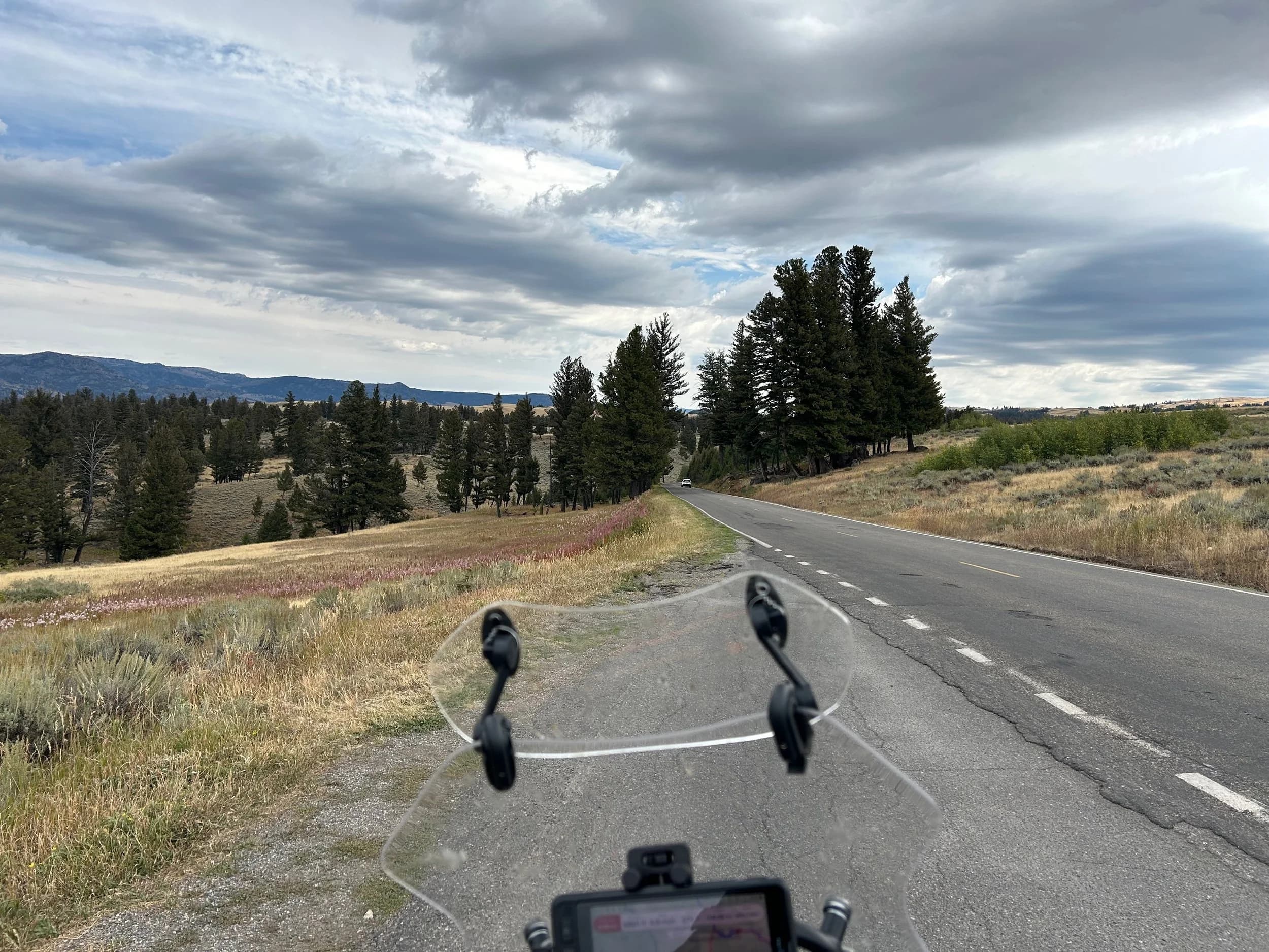 Trip Report: NW National Parks Loop
I left my job recently to take a much needed sabbatical and figure out what I’m doing next. A few weeks after my last day at work I embarked on what was to be a three week tour of NW-ish National Parks from Portland, to include Olympic, North Cascades, Glacier, Yellowstone, Grand Teton, Craters of the Moon, Lassen Volcanic, and Crater Lake.
I ended up missing Grand Tetons due to weather and I had to cut the trip short before I got to Lassen (family medical issue), so Lassen and Crater Lake remain unvisited.
Trip Dates: Sept 3 - Sept 16 (13 days)
Total Travel Miles: 3478 (does not include local miles for store runs, etc.)
Total Gallons of Gas Used: 82
Equipment: 2021 Benelli TRK502X Gaia GPS & Google Maps running on Sonim XP8 rugged Android phoneButler Motorcycle Maps (paper maps of best M/C roads in the country) iPhone 14 (main camera) Akaso Brave 7 helmet-mounted adventure camera Spot X satellite communicator and tracker Wolfman Luggage WP waterproof tank bag and saddle bags (no longer available) Watershed Colorado dry bag duffel (across the pillion seat) Kriega US-5 Drypack (tail bag) Kriega 3L hydration backpack (strapped to duffel, not worn)Marmot Ajax 2 tent Nemo hydrophobic down sleeping bag (non-mummy)Helinox ultralight cot MSR WhisperLite International stove
(Purchased in 1991 for my first moto trip: Detroit, MI to San Diego and back on an XT250)Gossamer Gear Bare Boxer bear-proof food canisters (two - one in each saddle bag)
Day 1 - Olympic National Park Date: Tuesday 9/3/2024
Destination: South Beach Campground, Olympic National Park
Travel Time: 4h 24m
Miles: 213Notes:
Planned to head west to Astoria then north from there, but left later than expected so headed up I-5 to US 12. I’ve driven/ridden that stretch of I-5 hundreds of times (starting in 1993). It’s boring and I hate it.
South Beach CG is first-come-first-served. I didn’t have issue getting a site. There is a long, tight loop of sites along the coastline, but I chose one of the sites further back near the bathrooms due to wind concerns. The bathroom building provided a sort of wind shelter for my site.
I used the heated grips on this leg; it was pretty chilly along the coast in the Olympic Peninsula. I almost didn’t install them, thinking I was being paranoid about the cold. I ended up using them a lot.
Day 2 - Ferry to Seattle / Burien Date: Wednesday 9/4/2024
Destination: Friend’s house in Burien, WA
Travel Time: 7h 30m
Miles: 199
Notes:
Slept well (thanks to Advil PM). I’ve not been sleeping well for more than a year. I’m really hoping to reset my sleep patterns with this trip. A good night’s sleep is one of my great joys and I feel like I’ve been robbed of that pleasure.
Used my Aeropress this morning for the first time ever. I’m hooked.
Headed up along US 101 through Port Angeles and then down to the Southworth ferry terminal near Port Orchard. Ferried across to Fauntleroy, which is just a few miles north my friend’s house in Burien. I’m always surprised at how long it takes to get from the Olympic Peninsula to the east side of Puget Sound (Seattle, etc.). With the ferry crossing (I love ferries) it took seven and a half hours to go 200 miles.
Discovered at my first stop of the day (just up 101 at the Kalaloch Campground, stopped to refill water) that the battery is quite weak and won’t start the bike if you leave the ignition on for even two minutes without the motor running. This would become a theme for the next few days. Fortunately, I have a jumper box and a permanent jump harness wired to the battery so jump starts are a quick operation.
Had a good evening with old friends.
Day 3 - North Cascades via Mountain Loop RoadDate: Thursday 9/5/2024
Destination: Newhalem Campground, North Cascades National Park
Travel Time: 4h 30m
Miles: 146Notes:
Slept well, on the couch. No pills needed.
I realized yesterday that my summer riding gloves (Rev’It Dune) were a size (or two) too small. Rev’It gloves fit really tight and I feel like I can never get it quite right. And yet, I love them. So, I stopped at a Cycle Gear in Bellevue to pick up something summer weight (Dirt 3) that fit better. They’re better, but maybe still one size too small. Such is life.
From Bellevue, I rode north and took the Mountain Loop Hwy then on up north to North Cascades. It was a hot ride. Still summer.
A small section of the Mountain Loop Road is dirt/gravel, which I didn’t realize. No biggie. Was just surprised (clearly I didn’t study my maps closely enough). When riding solo on a bike that weighs over 500 lbs., I tend to avoid planning much off-pavement riding. That’s what my DR-Z is for.
Day 4 - Newport, Washington via Winthrop Date: Friday 9/6/2024
Destination: Golden Spur Motor Inn, Newport, Washington
Travel Time: 8h
Miles: 308
Notes:
Slept just ok, even with Advil PM.
Pretty ride through North Cascades National Park and Colville National Forest. Didn’t do any backroads or hikes. Discovered (new to me) the town of Winthrop. Stopped for coffee at Sheri’s and resupplied on freeze-dried food at Cascades Outdoor Store.
The town of Newport is almost nothing, but, inexplicably, there’s an amazing restaurant (Brownell’s Place). Had dinner and a few ciders. Met and chatted with the owner/chef (she’s great). Listened to some live music. Then back to the motel.
Day 5 - New Battery in Kalispell Date: Saturday 9/7/2024
Destination: West Glacier KOA, West Glacier, MT
Travel Time: 8h 7m
Miles: 293
Notes:
Slept well on motel bed (on sleeping bag, not in the sheets). Another hot one.
Discovered that the water pump seal leaks oil. A quick post in the TRK Facebook group revealed that this is a common problem on this bike, and and easy fix. It’s apparently just a bad o-ring.
Battery has been getting continuously worse, and now requires I jump start the bike about every other start. Google Maps to the rescue: directions to the Batteries Plus in Kalispell, please. They don’t have an Odyssey AGM in the right size; the Duracell will have to do. (It’s been great.)
I set up camp at the West Glacier KOA, which will be my base for a few days. KOAs are their own little world. Very strange. Not really my thing, but the on-site laundry was handy.
After setting up camp I opened a cider and used the iPad to book a vehicle reservation for the next day to ride Going to the Sun Road, which I really wanted to do.
Day 6 - Going to the Sun RoadDate: Sunday 9/8/2024
Destination: Local Ride: West Glacier, Going to the Sun Road, Saint Mary, East Glacier
Travel Time: 5h 35m
Miles: 142Notes:
Quick breakfast and gas up in West Glacier before entering Going to the Sun Road.
Going to the Sun Road was stunning. This was the first point in the trip where I had tingles and was giddy at what I was seeing.
Took a very short hike along Saint Mary Lake. Again, I was beside myself with the beauty.
Lunch at the general store in Kiowa.
The rest of the ride back after East Glacier was meh, but I just kept thinking about how amazing what I’d seen in the morning had been.
Dinner at the KOA. Tacos from a cart (ok / not great, and a very weird guacamole) and a few glasses of wine from another cart. I asked about the guac and it turns out they make it in a food processor. Come on, people.
Day 7 - Ride to BozemanDate: Monday 9/9/2024
Destination: Friend’s house in Bozeman, Montana
Travel Time: ~ 8h (Gaia crashed near the end of the trip, but before getting to Bozeman)
Miles: ~ 400Notes:
Slept poorly again. No pills this time. Took some photos of my soft luggage setup to answer some questions in the TRK502X Facebook group. The saddle bags are from Wolfman Luggage, but I don’t think they make this waterproof line anymore. I use a duffel dry bag from Watershed across the top. A heat shield protects the side bag from exhaust heat.
Hazy, smoky ride most of the way. Very windy in places. This is where I first really started to feel how underpowered the TRK502 is. Really struggled in places.
Developed an engine-speed-sensitive squeak or rattle. Sounds like when a heat shield vibrates in resonance with engine vibration. Discovered that it’s a missing crash bar mounting bolt allowing the crash bar to rub against the frame.
Also noticed that there’s a resonant oscillation at speed that feels like the chain going bad (like it’s stretching unevenly).
First of several nights at a friend’s house in Bozeman (which, it turns out, is a pretty cool town). And there’s a hot tub…
Day 8 - Bike Maintenance & Hyalite ReservoirDate: Tuesday 9/10/2024
Destination: Local Ride: Hyalite Reservoir
Travel Time: not recorded
Miles: not recordedNotes:
Woke up to a smoky sunrise. I had the best night’s sleep I’ve had in years. This is was the whole point of this trip: to untangle my burnout and reclaim sleep as one of my joys. I wrote about it in my journal when I woke up. I hope this wasn’t a fluke.
Planned to replace the bolt that rattled loose from the crash bar, but instead discovered that it had actually severed off at the mount point. No fixing that on the road. Adjusted chain and moved on.
Lunch at Mountains Walking Brewery in Bozeman.
Rode up to Hyalite Reservoir. Pretty ride. Smoky still.
Soaked in hot tub after dinner.
Day 9 - North Yellowstone LoopDate: Wednesday 9/11/2024
Destination: Northern loop through Yellowstone National Park
Travel Time: 9h 36m
Miles: 272Notes:
Did a day trip from Bozeman down through the northern loop in Yellowstone, entering at Mammoth and taking the scenic route through Paradise Valley.
Saw elk, coyotes (I think), buffalo, and pronghorn.
Pretty ride, but cold in places. Used heated grips again.
Rode the loop through Mammoth Hot Springs (see video) at the end.
Coffee at Tumbleweed Bookstore & Cafe in Gardiner. I kind of dig Gardiner. Good vibe.
Had dinner at Mountains Walking Brewing. Rain and wind started. Lights flickered. Waited for rain to stop before riding back to the house.
Power out at the house due to high winds. This does not bode well for tomorrow.
Day 10 - Winter Weather in the ParksDate: Thursday 9/12/2024
Destination: Grand Teton National Park via West Yellowstone Pocatello, Idaho
Travel Time: 5h 40m
Miles: 201Notes:
Today was supposed to be a gorgeous ride through Yellowstone into Grand Teton National Park, and camping at Signal Mountain CG in the park. The weather had other ideas. It was pouring rain (and cold) all the way to West Yellowstone from Bozeman. By the time I got to West Yellowstone I was getting severe winter weather warnings on my phone calling for up to 3 (three!!) inches of snow accumulating in the high passes in the park. It’s bad enough in a car, but that’s a disaster waiting to happen on a motorcycle.
I parked my butt at Mountain Mama’s Cafe in West Yellowstone to warm up / dry off and decide what to do. I almost had myself convinced to push through when I realized that, even if I made it to the campground ok, I’d be setting up camp in the rain and I’d likely be miserable all night. Grand Teton would have to wait.
From West Yellowstone it’s easy to bail west into Idaho and get away from the park weather and elevations. So that’s what I did. It was not a pleasant ride, though. I was in torrential downpours all the way to Idaho Falls.
Arriving in Idaho Falls, I was exhausted and sure I could just find a room for the night. I dropped the bike at a roundabout (short-legged it coming to a stop; I knew it was going so I just rolled away). Guy behind me helped me pick it up. Then, there were no rooms because it was move in week for the two universities there (U of I, ISU). This would become a recurring theme.
I rode further to Blackfoot. Still no rooms.
I called ahead to Pocatello and got a room at a Red Lion there. I was never so happy to be off the bike.
No pictures this day. I couldn’t even get the action camera to turn on.
Day 11 - Craters of the Moon and EBR-1Date: Friday 9/13/2024
Destination: Craters of the Moon National Monument
Travel Time: 4h 20m
Miles: 124
Notes:
I wasn’t sure what my destination would be today but my plan was to do a little nuclear tourism, see Craters of the Moon, and then go somewhere from there. My schedule and day-plan was thrown off by missing Grand Teton National Park and spending a night in Pocatello, which was not on the itinerary at all.
Stopped in Atomic City. Not sure why; I was under the impression that Atomic City was the first city lit by nuclear engergy, but it was practically a ghost town. There are a few houses there, but as far as I could tell all of the business were shuttered. Except, maybe, for the race track; that looked like it might still get used.
Arco, it turns out, is the city celebrated as the first in the world to be lit by nuclear energy. Nothing special about the town, but they do a nice job of making City Hall photo-worthy.
Between Atomic City and Arco is EBR-1 (Experimental Breeder Reactor I) which was the world’s first breeder reactor. The EBR-1 exhibit was closed for the season, but in the lot next to it were some really interesting experimental nuclear heat-transfer jet engines that never made it out of the experimental phase (probably a good thing).
Craters of the Moon is pretty small. If you don’t do any of the walks, it’s literally just a 30 minute road loop. Still, it was an unexpected surprise and delight. I had no idea what to expect but I was positively chuffed at the experience. I noticed that the campground had open sites so I inquired at the entry booth. As luck would have it, the whole campground is first come / first serve. I decided to set up for the night. It’s good to be done early and have some time to read and not stress about making distance.
Day 12 - New Chain in Twin FallsDate: Saturday 9/14/2024
Destination: Battle Mountain, Nevada
Travel Time: 8h 52m
Miles: 335
Notes:
Beautiful morning in Craters of the Moon. While I was breaking camp a parade of classic cars came into the park to drive the loop. I got a picture of one Pontiac down the road in Carey at a gas station.
Carey ended up being an unplanned fork in the road for me. I discovered this morning that my chain was indeed stretching unevenly, and the oscillation I was feeling and hearing was the chain hum changing from a “loose” hum to a “tight” hum rapidly as the tight spot moved around the sprockets. I was supposed to continue west to Mountain Home and then south from there into Nevada. A very scenic route, according to my Butler map. But, between camp and the gas station I got pretty paranoid about the chain snapping at high speed, which, worst case, could lead to a fatal crash.
So I called ahead to a few motorcycle dealers in Mountain Home (on my planned route) to see if they could take me in and replace the chain. No dice. This is the downside of having an obscure motorcycle from an obscure marque - no one wants to work on it. Making matters worse this is an Italian-designed bike built in China, a fact which causes many people to lose the ability to think clearly. “It’s Chinese junk!” Not so. Next.
With Mountain Home out, I tried Twin Falls. My first call was to Adventure Motorsports, and the service manager there took me in with no hesitation. “How soon can you be here?” I didn’t get his name, but my hat’s off to him and his one tech working furiously on a Saturday to beat the 3pm closing time. He said during high season, they get about 15-20 out of town travelers per week who need something done, and they take them all in. I love to hear stuff like this. This shop is in it for the community. They have a nice showroom, too.
With a quality new chain installed, I got a burrito and a MexiCoke at a Mexican place and went on my way. I made it to Battle Mountain, NV, where I decide to get a room. Tomorrow I rejoin my planned scenic route. Day 13 - Desert Mountains in NV, CADate: Sunday 9/15/2024
Destination: Grizzly Campground, Lake Davis (near Portola, CA)
Travel Time: 7h
Miles: 307
Notes:
I love the northern Nevada landscape, and today’s ride didn’t disappoint. US Highway 50 is apparently known as “The Loneliest Highway” but everyone knows about it, so it’s not very lonely. However, after leaving Austin, NV headed west you can take Nevada Highway 722, which dips to the south and follows the old US 50 route. It was completely empty and the twisties through the passes were fun. Highly recommended.
Stopped in Fallon for gas and to find a Micro SD card for the action camera. Walmart to the rescue.
After Reno, I crossed into California and, I swear, it looks different. Norther California desert mountains are so beautiful.
Camped at a nearly empty campground on Lake Davis (very end of the season). The host warned me rain was coming tomorrow.
Day 14 - Unplanned Return HomeDate: Monday 9/16/2024
Destination: Summit Lake Campground, Lassen Volcanic National Park Portland, Oregon (Home)
Travel Time: 10h 32m
Miles: 538Notes:
Last week, my mom went into the hospital for a fairly routine procedure. My brother went to Michigan to help out, as needed, and he went back home to Arizona after she returned home and everything seemed settled.
This morning, while having coffee, I got a call that she’d gone back into the hospital with something that may or may not have been related to the procedure. It seemed like maybe things were ok, but maybe not.
I decided the best thing to do was head home so that I was near an airport if I needed to fly out to Michigan to help out.
I packed up camp and headed up US 395 toward home, via Klamath Falls. It was a pretty ride, but, once again, I found myself in rain most of the way to Klamath Falls.
I was pretty beat by the time I got to Klamath Falls and figured I’d just find a hotel room, get a hot shower, and finish the ride tomorrow.
But, once again, it was move-in week for the local university. Holiday Inn Express had a single room for $395. No thanks. Onward.
I never hit rain again after Klamath Falls, and after turning west onto Oregon Hwy 58 and starting to lose elevation into the Willamette Valley, the temperature starting rising, which was welcome.
Once I reached Eugene, there was no point in not just going all the way home, so that’s what I did.
I got two pictures: one at camp before the call, and one at my last gas stop, an hour and twenty minutes from home, with the moon rising.
A nice side effect of my early return home is that I was home for my birthday (tomorrow), so I had dinner with my kids and my wife, which was lovely.
I did end up flying to Michigan the next day, and was there for a bit. The best part? I got to make some meals for my mom and step dad. Everything seems ok with my mom for now.
Grand Teton, Lassen, and Crater Lake will be there, and now I have an excuse for another trip in the future.