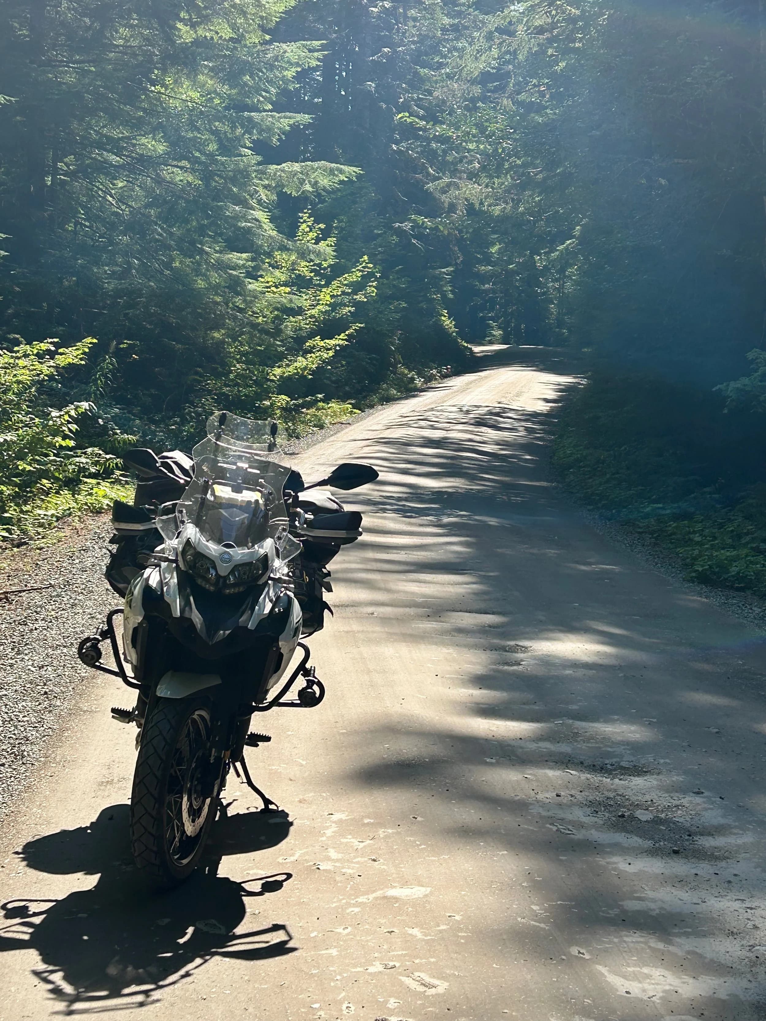 Trip Report: NW National Parks Loop
I left my job recently to take a much needed sabbatical and figure out what I’m doing next. A few weeks after my last day at work I embarked on what was to be a three week tour of NW-ish National Parks from Portland, to include Olympic, North Cascades, Glacier, Yellowstone, Grand Teton, Craters of the Moon, Lassen Volcanic, and Crater Lake.
I ended up missing Grand Tetons due to weather and I had to cut the trip short before I got to Lassen (family medical issue), so Lassen and Crater Lake remain unvisited.
Trip Dates: Sept 3 - Sept 16 (13 days)
Total Travel Miles: 3478 (does not include local miles for store runs, etc.)
Total Gallons of Gas Used: 82
Equipment: 2021 Benelli TRK502X Gaia GPS & Google Maps running on Sonim XP8 rugged Android phoneButler Motorcycle Maps (paper maps of best M/C roads in the country) iPhone 14 (main camera) Akaso Brave 7 helmet-mounted adventure camera Spot X satellite communicator and tracker Wolfman Luggage WP waterproof tank bag and saddle bags (no longer available) Watershed Colorado dry bag duffel (across the pillion seat) Kriega US-5 Drypack (tail bag) Kriega 3L hydration backpack (strapped to duffel, not worn)Marmot Ajax 2 tent Nemo hydrophobic down sleeping bag (non-mummy)Helinox ultralight cot MSR WhisperLite International stove
(Purchased in 1991 for my first moto trip: Detroit, MI to San Diego and back on an XT250)Gossamer Gear Bare Boxer bear-proof food canisters (two - one in each saddle bag)
Day 1 - Olympic National Park Date: Tuesday 9/3/2024
Destination: South Beach Campground, Olympic National Park
Travel Time: 4h 24m
Miles: 213Notes:
Planned to head west to Astoria then north from there, but left later than expected so headed up I-5 to US 12. I’ve driven/ridden that stretch of I-5 hundreds of times (starting in 1993). It’s boring and I hate it.
South Beach CG is first-come-first-served. I didn’t have issue getting a site. There is a long, tight loop of sites along the coastline, but I chose one of the sites further back near the bathrooms due to wind concerns. The bathroom building provided a sort of wind shelter for my site.
I used the heated grips on this leg; it was pretty chilly along the coast in the Olympic Peninsula. I almost didn’t install them, thinking I was being paranoid about the cold. I ended up using them a lot.
Day 2 - Ferry to Seattle / Burien Date: Wednesday 9/4/2024
Destination: Friend’s house in Burien, WA
Travel Time: 7h 30m
Miles: 199
Notes:
Slept well (thanks to Advil PM). I’ve not been sleeping well for more than a year. I’m really hoping to reset my sleep patterns with this trip. A good night’s sleep is one of my great joys and I feel like I’ve been robbed of that pleasure.
Used my Aeropress this morning for the first time ever. I’m hooked.
Headed up along US 101 through Port Angeles and then down to the Southworth ferry terminal near Port Orchard. Ferried across to Fauntleroy, which is just a few miles north my friend’s house in Burien. I’m always surprised at how long it takes to get from the Olympic Peninsula to the east side of Puget Sound (Seattle, etc.). With the ferry crossing (I love ferries) it took seven and a half hours to go 200 miles.
Discovered at my first stop of the day (just up 101 at the Kalaloch Campground, stopped to refill water) that the battery is quite weak and won’t start the bike if you leave the ignition on for even two minutes without the motor running. This would become a theme for the next few days. Fortunately, I have a jumper box and a permanent jump harness wired to the battery so jump starts are a quick operation.
Had a good evening with old friends.
Day 3 - North Cascades via Mountain Loop RoadDate: Thursday 9/5/2024
Destination: Newhalem Campground, North Cascades National Park
Travel Time: 4h 30m
Miles: 146Notes:
Slept well, on the couch. No pills needed.
I realized yesterday that my summer riding gloves (Rev’It Dune) were a size (or two) too small. Rev’It gloves fit really tight and I feel like I can never get it quite right. And yet, I love them. So, I stopped at a Cycle Gear in Bellevue to pick up something summer weight (Dirt 3) that fit better. They’re better, but maybe still one size too small. Such is life.
From Bellevue, I rode north and took the Mountain Loop Hwy then on up north to North Cascades. It was a hot ride. Still summer.
A small section of the Mountain Loop Road is dirt/gravel, which I didn’t realize. No biggie. Was just surprised (clearly I didn’t study my maps closely enough). When riding solo on a bike that weighs over 500 lbs., I tend to avoid planning much off-pavement riding. That’s what my DR-Z is for.
Day 4 - Newport, Washington via Winthrop Date: Friday 9/6/2024
Destination: Golden Spur Motor Inn, Newport, Washington
Travel Time: 8h
Miles: 308
Notes:
Slept just ok, even with Advil PM.
Pretty ride through North Cascades National Park and Colville National Forest. Didn’t do any backroads or hikes. Discovered (new to me) the town of Winthrop. Stopped for coffee at Sheri’s and resupplied on freeze-dried food at Cascades Outdoor Store.
The town of Newport is almost nothing, but, inexplicably, there’s an amazing restaurant (Brownell’s Place). Had dinner and a few ciders. Met and chatted with the owner/chef (she’s great). Listened to some live music. Then back to the motel.
Day 5 - New Battery in Kalispell Date: Saturday 9/7/2024
Destination: West Glacier KOA, West Glacier, MT
Travel Time: 8h 7m
Miles: 293
Notes:
Slept well on motel bed (on sleeping bag, not in the sheets). Another hot one.
Discovered that the water pump seal leaks oil. A quick post in the TRK Facebook group revealed that this is a common problem on this bike, and and easy fix. It’s apparently just a bad o-ring.
Battery has been getting continuously worse, and now requires I jump start the bike about every other start. Google Maps to the rescue: directions to the Batteries Plus in Kalispell, please. They don’t have an Odyssey AGM in the right size; the Duracell will have to do. (It’s been great.)
I set up camp at the West Glacier KOA, which will be my base for a few days. KOAs are their own little world. Very strange. Not really my thing, but the on-site laundry was handy.
After setting up camp I opened a cider and used the iPad to book a vehicle reservation for the next day to ride Going to the Sun Road, which I really wanted to do.
Day 6 - Going to the Sun RoadDate: Sunday 9/8/2024
Destination: Local Ride: West Glacier, Going to the Sun Road, Saint Mary, East Glacier
Travel Time: 5h 35m
Miles: 142Notes:
Quick breakfast and gas up in West Glacier before entering Going to the Sun Road.
Going to the Sun Road was stunning. This was the first point in the trip where I had tingles and was giddy at what I was seeing.
Took a very short hike along Saint Mary Lake. Again, I was beside myself with the beauty.
Lunch at the general store in Kiowa.
The rest of the ride back after East Glacier was meh, but I just kept thinking about how amazing what I’d seen in the morning had been.
Dinner at the KOA. Tacos from a cart (ok / not great, and a very weird guacamole) and a few glasses of wine from another cart. I asked about the guac and it turns out they make it in a food processor. Come on, people.
Day 7 - Ride to BozemanDate: Monday 9/9/2024
Destination: Friend’s house in Bozeman, Montana
Travel Time: ~ 8h (Gaia crashed near the end of the trip, but before getting to Bozeman)
Miles: ~ 400Notes:
Slept poorly again. No pills this time. Took some photos of my soft luggage setup to answer some questions in the TRK502X Facebook group. The saddle bags are from Wolfman Luggage, but I don’t think they make this waterproof line anymore. I use a duffel dry bag from Watershed across the top. A heat shield protects the side bag from exhaust heat.
Hazy, smoky ride most of the way. Very windy in places. This is where I first really started to feel how underpowered the TRK502 is. Really struggled in places.
Developed an engine-speed-sensitive squeak or rattle. Sounds like when a heat shield vibrates in resonance with engine vibration. Discovered that it’s a missing crash bar mounting bolt allowing the crash bar to rub against the frame.
Also noticed that there’s a resonant oscillation at speed that feels like the chain going bad (like it’s stretching unevenly).
First of several nights at a friend’s house in Bozeman (which, it turns out, is a pretty cool town). And there’s a hot tub…
Day 8 - Bike Maintenance & Hyalite ReservoirDate: Tuesday 9/10/2024
Destination: Local Ride: Hyalite Reservoir
Travel Time: not recorded
Miles: not recordedNotes:
Woke up to a smoky sunrise. I had the best night’s sleep I’ve had in years. This is was the whole point of this trip: to untangle my burnout and reclaim sleep as one of my joys. I wrote about it in my journal when I woke up. I hope this wasn’t a fluke.
Planned to replace the bolt that rattled loose from the crash bar, but instead discovered that it had actually severed off at the mount point. No fixing that on the road. Adjusted chain and moved on.
Lunch at Mountains Walking Brewery in Bozeman.
Rode up to Hyalite Reservoir. Pretty ride. Smoky still.
Soaked in hot tub after dinner.
Day 9 - North Yellowstone LoopDate: Wednesday 9/11/2024
Destination: Northern loop through Yellowstone National Park
Travel Time: 9h 36m
Miles: 272Notes:
Did a day trip from Bozeman down through the northern loop in Yellowstone, entering at Mammoth and taking the scenic route through Paradise Valley.
Saw elk, coyotes (I think), buffalo, and pronghorn.
Pretty ride, but cold in places. Used heated grips again.
Rode the loop through Mammoth Hot Springs (see video) at the end.
Coffee at Tumbleweed Bookstore & Cafe in Gardiner. I kind of dig Gardiner. Good vibe.
Had dinner at Mountains Walking Brewing. Rain and wind started. Lights flickered. Waited for rain to stop before riding back to the house.
Power out at the house due to high winds. This does not bode well for tomorrow.
Day 10 - Winter Weather in the ParksDate: Thursday 9/12/2024
Destination: Grand Teton National Park via West Yellowstone Pocatello, Idaho
Travel Time: 5h 40m
Miles: 201Notes:
Today was supposed to be a gorgeous ride through Yellowstone into Grand Teton National Park, and camping at Signal Mountain CG in the park. The weather had other ideas. It was pouring rain (and cold) all the way to West Yellowstone from Bozeman. By the time I got to West Yellowstone I was getting severe winter weather warnings on my phone calling for up to 3 (three!!) inches of snow accumulating in the high passes in the park. It’s bad enough in a car, but that’s a disaster waiting to happen on a motorcycle.
I parked my butt at Mountain Mama’s Cafe in West Yellowstone to warm up / dry off and decide what to do. I almost had myself convinced to push through when I realized that, even if I made it to the campground ok, I’d be setting up camp in the rain and I’d likely be miserable all night. Grand Teton would have to wait.
From West Yellowstone it’s easy to bail west into Idaho and get away from the park weather and elevations. So that’s what I did. It was not a pleasant ride, though. I was in torrential downpours all the way to Idaho Falls.
Arriving in Idaho Falls, I was exhausted and sure I could just find a room for the night. I dropped the bike at a roundabout (short-legged it coming to a stop; I knew it was going so I just rolled away). Guy behind me helped me pick it up. Then, there were no rooms because it was move in week for the two universities there (U of I, ISU). This would become a recurring theme.
I rode further to Blackfoot. Still no rooms.
I called ahead to Pocatello and got a room at a Red Lion there. I was never so happy to be off the bike.
No pictures this day. I couldn’t even get the action camera to turn on.
Day 11 - Craters of the Moon and EBR-1Date: Friday 9/13/2024
Destination: Craters of the Moon National Monument
Travel Time: 4h 20m
Miles: 124
Notes:
I wasn’t sure what my destination would be today but my plan was to do a little nuclear tourism, see Craters of the Moon, and then go somewhere from there. My schedule and day-plan was thrown off by missing Grand Teton National Park and spending a night in Pocatello, which was not on the itinerary at all.
Stopped in Atomic City. Not sure why; I was under the impression that Atomic City was the first city lit by nuclear engergy, but it was practically a ghost town. There are a few houses there, but as far as I could tell all of the business were shuttered. Except, maybe, for the race track; that looked like it might still get used.
Arco, it turns out, is the city celebrated as the first in the world to be lit by nuclear energy. Nothing special about the town, but they do a nice job of making City Hall photo-worthy.
Between Atomic City and Arco is EBR-1 (Experimental Breeder Reactor I) which was the world’s first breeder reactor. The EBR-1 exhibit was closed for the season, but in the lot next to it were some really interesting experimental nuclear heat-transfer jet engines that never made it out of the experimental phase (probably a good thing).
Craters of the Moon is pretty small. If you don’t do any of the walks, it’s literally just a 30 minute road loop. Still, it was an unexpected surprise and delight. I had no idea what to expect but I was positively chuffed at the experience. I noticed that the campground had open sites so I inquired at the entry booth. As luck would have it, the whole campground is first come / first serve. I decided to set up for the night. It’s good to be done early and have some time to read and not stress about making distance.
Day 12 - New Chain in Twin FallsDate: Saturday 9/14/2024
Destination: Battle Mountain, Nevada
Travel Time: 8h 52m
Miles: 335
Notes:
Beautiful morning in Craters of the Moon. While I was breaking camp a parade of classic cars came into the park to drive the loop. I got a picture of one Pontiac down the road in Carey at a gas station.
Carey ended up being an unplanned fork in the road for me. I discovered this morning that my chain was indeed stretching unevenly, and the oscillation I was feeling and hearing was the chain hum changing from a “loose” hum to a “tight” hum rapidly as the tight spot moved around the sprockets. I was supposed to continue west to Mountain Home and then south from there into Nevada. A very scenic route, according to my Butler map. But, between camp and the gas station I got pretty paranoid about the chain snapping at high speed, which, worst case, could lead to a fatal crash.
So I called ahead to a few motorcycle dealers in Mountain Home (on my planned route) to see if they could take me in and replace the chain. No dice. This is the downside of having an obscure motorcycle from an obscure marque - no one wants to work on it. Making matters worse this is an Italian-designed bike built in China, a fact which causes many people to lose the ability to think clearly. “It’s Chinese junk!” Not so. Next.
With Mountain Home out, I tried Twin Falls. My first call was to Adventure Motorsports, and the service manager there took me in with no hesitation. “How soon can you be here?” I didn’t get his name, but my hat’s off to him and his one tech working furiously on a Saturday to beat the 3pm closing time. He said during high season, they get about 15-20 out of town travelers per week who need something done, and they take them all in. I love to hear stuff like this. This shop is in it for the community. They have a nice showroom, too.
With a quality new chain installed, I got a burrito and a MexiCoke at a Mexican place and went on my way. I made it to Battle Mountain, NV, where I decide to get a room. Tomorrow I rejoin my planned scenic route. Day 13 - Desert Mountains in NV, CADate: Sunday 9/15/2024
Destination: Grizzly Campground, Lake Davis (near Portola, CA)
Travel Time: 7h
Miles: 307
Notes:
I love the northern Nevada landscape, and today’s ride didn’t disappoint. US Highway 50 is apparently known as “The Loneliest Highway” but everyone knows about it, so it’s not very lonely. However, after leaving Austin, NV headed west you can take Nevada Highway 722, which dips to the south and follows the old US 50 route. It was completely empty and the twisties through the passes were fun. Highly recommended.
Stopped in Fallon for gas and to find a Micro SD card for the action camera. Walmart to the rescue.
After Reno, I crossed into California and, I swear, it looks different. Norther California desert mountains are so beautiful.
Camped at a nearly empty campground on Lake Davis (very end of the season). The host warned me rain was coming tomorrow.
Day 14 - Unplanned Return HomeDate: Monday 9/16/2024
Destination: Summit Lake Campground, Lassen Volcanic National Park Portland, Oregon (Home)
Travel Time: 10h 32m
Miles: 538Notes:
Last week, my mom went into the hospital for a fairly routine procedure. My brother went to Michigan to help out, as needed, and he went back home to Arizona after she returned home and everything seemed settled.
This morning, while having coffee, I got a call that she’d gone back into the hospital with something that may or may not have been related to the procedure. It seemed like maybe things were ok, but maybe not.
I decided the best thing to do was head home so that I was near an airport if I needed to fly out to Michigan to help out.
I packed up camp and headed up US 395 toward home, via Klamath Falls. It was a pretty ride, but, once again, I found myself in rain most of the way to Klamath Falls.
I was pretty beat by the time I got to Klamath Falls and figured I’d just find a hotel room, get a hot shower, and finish the ride tomorrow.
But, once again, it was move-in week for the local university. Holiday Inn Express had a single room for $395. No thanks. Onward.
I never hit rain again after Klamath Falls, and after turning west onto Oregon Hwy 58 and starting to lose elevation into the Willamette Valley, the temperature starting rising, which was welcome.
Once I reached Eugene, there was no point in not just going all the way home, so that’s what I did.
I got two pictures: one at camp before the call, and one at my last gas stop, an hour and twenty minutes from home, with the moon rising.
A nice side effect of my early return home is that I was home for my birthday (tomorrow), so I had dinner with my kids and my wife, which was lovely.
I did end up flying to Michigan the next day, and was there for a bit. The best part? I got to make some meals for my mom and step dad. Everything seems ok with my mom for now.
Grand Teton, Lassen, and Crater Lake will be there, and now I have an excuse for another trip in the future.