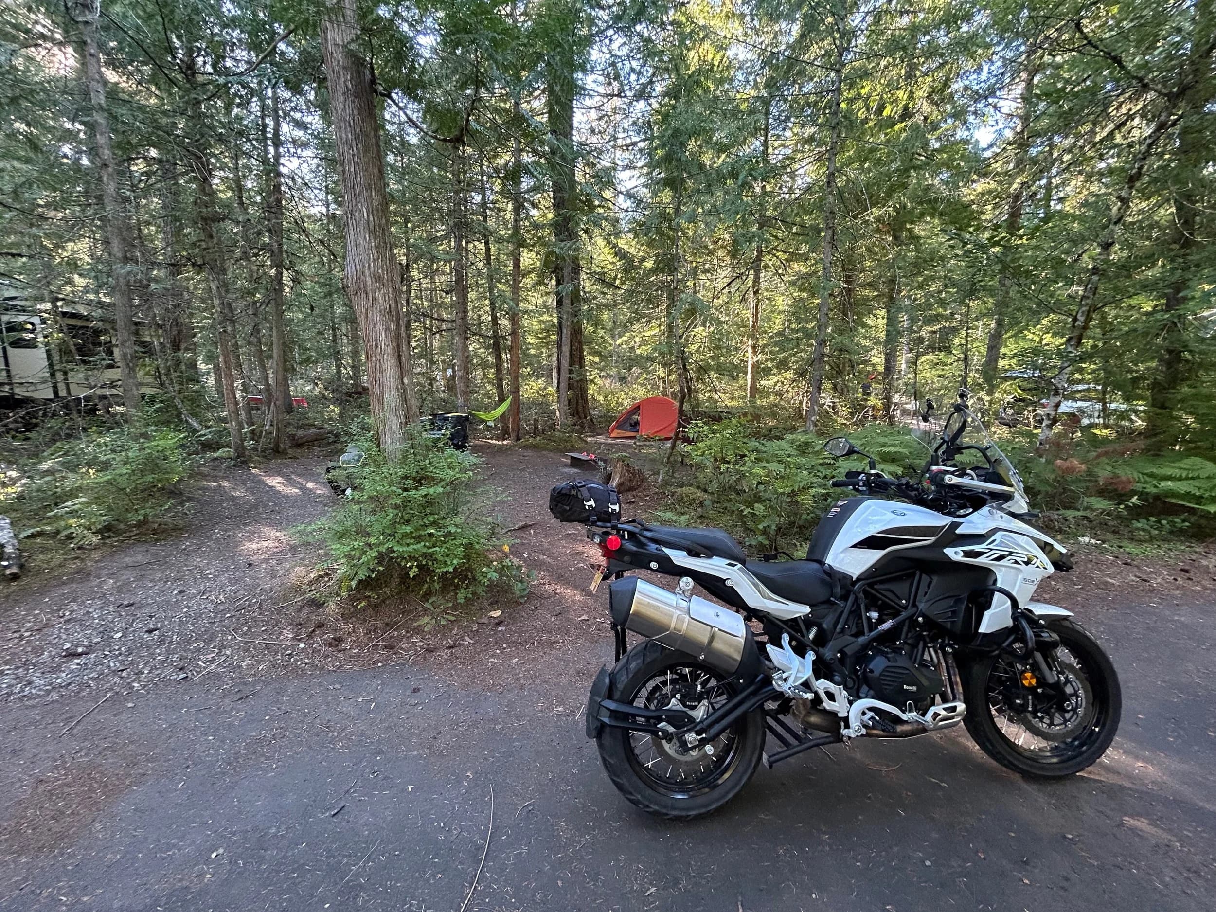 Trip Report: NW National Parks Loop
I left my job recently to take a much needed sabbatical and figure out what I’m doing next. A few weeks after my last day at work I embarked on what was to be a three week tour of NW-ish National Parks from Portland, to include Olympic, North Cascades, Glacier, Yellowstone, Grand Teton, Craters of the Moon, Lassen Volcanic, and Crater Lake.
I ended up missing Grand Tetons due to weather and I had to cut the trip short before I got to Lassen (family medical issue), so Lassen and Crater Lake remain unvisited.
Trip Dates: Sept 3 - Sept 16 (13 days)
Total Travel Miles: 3478 (does not include local miles for store runs, etc.)
Total Gallons of Gas Used: 82
Equipment: 2021 Benelli TRK502X Gaia GPS & Google Maps running on Sonim XP8 rugged Android phoneButler Motorcycle Maps (paper maps of best M/C roads in the country) iPhone 14 (main camera) Akaso Brave 7 helmet-mounted adventure camera Spot X satellite communicator and tracker Wolfman Luggage WP waterproof tank bag and saddle bags (no longer available) Watershed Colorado dry bag duffel (across the pillion seat) Kriega US-5 Drypack (tail bag) Kriega 3L hydration backpack (strapped to duffel, not worn)Marmot Ajax 2 tent Nemo hydrophobic down sleeping bag (non-mummy)Helinox ultralight cot MSR WhisperLite International stove
(Purchased in 1991 for my first moto trip: Detroit, MI to San Diego and back on an XT250)Gossamer Gear Bare Boxer bear-proof food canisters (two - one in each saddle bag)
Day 1 - Olympic National Park Date: Tuesday 9/3/2024
Destination: South Beach Campground, Olympic National Park
Travel Time: 4h 24m
Miles: 213Notes:
Planned to head west to Astoria then north from there, but left later than expected so headed up I-5 to US 12. I’ve driven/ridden that stretch of I-5 hundreds of times (starting in 1993). It’s boring and I hate it.
South Beach CG is first-come-first-served. I didn’t have issue getting a site. There is a long, tight loop of sites along the coastline, but I chose one of the sites further back near the bathrooms due to wind concerns. The bathroom building provided a sort of wind shelter for my site.
I used the heated grips on this leg; it was pretty chilly along the coast in the Olympic Peninsula. I almost didn’t install them, thinking I was being paranoid about the cold. I ended up using them a lot.
Day 2 - Ferry to Seattle / Burien Date: Wednesday 9/4/2024
Destination: Friend’s house in Burien, WA
Travel Time: 7h 30m
Miles: 199
Notes:
Slept well (thanks to Advil PM). I’ve not been sleeping well for more than a year. I’m really hoping to reset my sleep patterns with this trip. A good night’s sleep is one of my great joys and I feel like I’ve been robbed of that pleasure.
Used my Aeropress this morning for the first time ever. I’m hooked.
Headed up along US 101 through Port Angeles and then down to the Southworth ferry terminal near Port Orchard. Ferried across to Fauntleroy, which is just a few miles north my friend’s house in Burien. I’m always surprised at how long it takes to get from the Olympic Peninsula to the east side of Puget Sound (Seattle, etc.). With the ferry crossing (I love ferries) it took seven and a half hours to go 200 miles.
Discovered at my first stop of the day (just up 101 at the Kalaloch Campground, stopped to refill water) that the battery is quite weak and won’t start the bike if you leave the ignition on for even two minutes without the motor running. This would become a theme for the next few days. Fortunately, I have a jumper box and a permanent jump harness wired to the battery so jump starts are a quick operation.
Had a good evening with old friends.
Day 3 - North Cascades via Mountain Loop RoadDate: Thursday 9/5/2024
Destination: Newhalem Campground, North Cascades National Park
Travel Time: 4h 30m
Miles: 146Notes:
Slept well, on the couch. No pills needed.
I realized yesterday that my summer riding gloves (Rev’It Dune) were a size (or two) too small. Rev’It gloves fit really tight and I feel like I can never get it quite right. And yet, I love them. So, I stopped at a Cycle Gear in Bellevue to pick up something summer weight (Dirt 3) that fit better. They’re better, but maybe still one size too small. Such is life.
From Bellevue, I rode north and took the Mountain Loop Hwy then on up north to North Cascades. It was a hot ride. Still summer.
A small section of the Mountain Loop Road is dirt/gravel, which I didn’t realize. No biggie. Was just surprised (clearly I didn’t study my maps closely enough). When riding solo on a bike that weighs over 500 lbs., I tend to avoid planning much off-pavement riding. That’s what my DR-Z is for.
Day 4 - Newport, Washington via Winthrop Date: Friday 9/6/2024
Destination: Golden Spur Motor Inn, Newport, Washington
Travel Time: 8h
Miles: 308
Notes:
Slept just ok, even with Advil PM.
Pretty ride through North Cascades National Park and Colville National Forest. Didn’t do any backroads or hikes. Discovered (new to me) the town of Winthrop. Stopped for coffee at Sheri’s and resupplied on freeze-dried food at Cascades Outdoor Store.
The town of Newport is almost nothing, but, inexplicably, there’s an amazing restaurant (Brownell’s Place). Had dinner and a few ciders. Met and chatted with the owner/chef (she’s great). Listened to some live music. Then back to the motel.
Day 5 - New Battery in Kalispell Date: Saturday 9/7/2024
Destination: West Glacier KOA, West Glacier, MT
Travel Time: 8h 7m
Miles: 293
Notes:
Slept well on motel bed (on sleeping bag, not in the sheets). Another hot one.
Discovered that the water pump seal leaks oil. A quick post in the TRK Facebook group revealed that this is a common problem on this bike, and and easy fix. It’s apparently just a bad o-ring.
Battery has been getting continuously worse, and now requires I jump start the bike about every other start. Google Maps to the rescue: directions to the Batteries Plus in Kalispell, please. They don’t have an Odyssey AGM in the right size; the Duracell will have to do. (It’s been great.)
I set up camp at the West Glacier KOA, which will be my base for a few days. KOAs are their own little world. Very strange. Not really my thing, but the on-site laundry was handy.
After setting up camp I opened a cider and used the iPad to book a vehicle reservation for the next day to ride Going to the Sun Road, which I really wanted to do.
Day 6 - Going to the Sun RoadDate: Sunday 9/8/2024
Destination: Local Ride: West Glacier, Going to the Sun Road, Saint Mary, East Glacier
Travel Time: 5h 35m
Miles: 142Notes:
Quick breakfast and gas up in West Glacier before entering Going to the Sun Road.
Going to the Sun Road was stunning. This was the first point in the trip where I had tingles and was giddy at what I was seeing.
Took a very short hike along Saint Mary Lake. Again, I was beside myself with the beauty.
Lunch at the general store in Kiowa.
The rest of the ride back after East Glacier was meh, but I just kept thinking about how amazing what I’d seen in the morning had been.
Dinner at the KOA. Tacos from a cart (ok / not great, and a very weird guacamole) and a few glasses of wine from another cart. I asked about the guac and it turns out they make it in a food processor. Come on, people.
Day 7 - Ride to BozemanDate: Monday 9/9/2024
Destination: Friend’s house in Bozeman, Montana
Travel Time: ~ 8h (Gaia crashed near the end of the trip, but before getting to Bozeman)
Miles: ~ 400Notes:
Slept poorly again. No pills this time. Took some photos of my soft luggage setup to answer some questions in the TRK502X Facebook group. The saddle bags are from Wolfman Luggage, but I don’t think they make this waterproof line anymore. I use a duffel dry bag from Watershed across the top. A heat shield protects the side bag from exhaust heat.
Hazy, smoky ride most of the way. Very windy in places. This is where I first really started to feel how underpowered the TRK502 is. Really struggled in places.
Developed an engine-speed-sensitive squeak or rattle. Sounds like when a heat shield vibrates in resonance with engine vibration. Discovered that it’s a missing crash bar mounting bolt allowing the crash bar to rub against the frame.
Also noticed that there’s a resonant oscillation at speed that feels like the chain going bad (like it’s stretching unevenly).
First of several nights at a friend’s house in Bozeman (which, it turns out, is a pretty cool town). And there’s a hot tub…
Day 8 - Bike Maintenance & Hyalite ReservoirDate: Tuesday 9/10/2024
Destination: Local Ride: Hyalite Reservoir
Travel Time: not recorded
Miles: not recordedNotes:
Woke up to a smoky sunrise. I had the best night’s sleep I’ve had in years. This is was the whole point of this trip: to untangle my burnout and reclaim sleep as one of my joys. I wrote about it in my journal when I woke up. I hope this wasn’t a fluke.
Planned to replace the bolt that rattled loose from the crash bar, but instead discovered that it had actually severed off at the mount point. No fixing that on the road. Adjusted chain and moved on.
Lunch at Mountains Walking Brewery in Bozeman.
Rode up to Hyalite Reservoir. Pretty ride. Smoky still.
Soaked in hot tub after dinner.
Day 9 - North Yellowstone LoopDate: Wednesday 9/11/2024
Destination: Northern loop through Yellowstone National Park
Travel Time: 9h 36m
Miles: 272Notes:
Did a day trip from Bozeman down through the northern loop in Yellowstone, entering at Mammoth and taking the scenic route through Paradise Valley.
Saw elk, coyotes (I think), buffalo, and pronghorn.
Pretty ride, but cold in places. Used heated grips again.
Rode the loop through Mammoth Hot Springs (see video) at the end.
Coffee at Tumbleweed Bookstore & Cafe in Gardiner. I kind of dig Gardiner. Good vibe.
Had dinner at Mountains Walking Brewing. Rain and wind started. Lights flickered. Waited for rain to stop before riding back to the house.
Power out at the house due to high winds. This does not bode well for tomorrow.
Day 10 - Winter Weather in the ParksDate: Thursday 9/12/2024
Destination: Grand Teton National Park via West Yellowstone Pocatello, Idaho
Travel Time: 5h 40m
Miles: 201Notes:
Today was supposed to be a gorgeous ride through Yellowstone into Grand Teton National Park, and camping at Signal Mountain CG in the park. The weather had other ideas. It was pouring rain (and cold) all the way to West Yellowstone from Bozeman. By the time I got to West Yellowstone I was getting severe winter weather warnings on my phone calling for up to 3 (three!!) inches of snow accumulating in the high passes in the park. It’s bad enough in a car, but that’s a disaster waiting to happen on a motorcycle.
I parked my butt at Mountain Mama’s Cafe in West Yellowstone to warm up / dry off and decide what to do. I almost had myself convinced to push through when I realized that, even if I made it to the campground ok, I’d be setting up camp in the rain and I’d likely be miserable all night. Grand Teton would have to wait.
From West Yellowstone it’s easy to bail west into Idaho and get away from the park weather and elevations. So that’s what I did. It was not a pleasant ride, though. I was in torrential downpours all the way to Idaho Falls.
Arriving in Idaho Falls, I was exhausted and sure I could just find a room for the night. I dropped the bike at a roundabout (short-legged it coming to a stop; I knew it was going so I just rolled away). Guy behind me helped me pick it up. Then, there were no rooms because it was move in week for the two universities there (U of I, ISU). This would become a recurring theme.
I rode further to Blackfoot. Still no rooms.
I called ahead to Pocatello and got a room at a Red Lion there. I was never so happy to be off the bike.
No pictures this day. I couldn’t even get the action camera to turn on.
Day 11 - Craters of the Moon and EBR-1Date: Friday 9/13/2024
Destination: Craters of the Moon National Monument
Travel Time: 4h 20m
Miles: 124
Notes:
I wasn’t sure what my destination would be today but my plan was to do a little nuclear tourism, see Craters of the Moon, and then go somewhere from there. My schedule and day-plan was thrown off by missing Grand Teton National Park and spending a night in Pocatello, which was not on the itinerary at all.
Stopped in Atomic City. Not sure why; I was under the impression that Atomic City was the first city lit by nuclear engergy, but it was practically a ghost town. There are a few houses there, but as far as I could tell all of the business were shuttered. Except, maybe, for the race track; that looked like it might still get used.
Arco, it turns out, is the city celebrated as the first in the world to be lit by nuclear energy. Nothing special about the town, but they do a nice job of making City Hall photo-worthy.
Between Atomic City and Arco is EBR-1 (Experimental Breeder Reactor I) which was the world’s first breeder reactor. The EBR-1 exhibit was closed for the season, but in the lot next to it were some really interesting experimental nuclear heat-transfer jet engines that never made it out of the experimental phase (probably a good thing).
Craters of the Moon is pretty small. If you don’t do any of the walks, it’s literally just a 30 minute road loop. Still, it was an unexpected surprise and delight. I had no idea what to expect but I was positively chuffed at the experience. I noticed that the campground had open sites so I inquired at the entry booth. As luck would have it, the whole campground is first come / first serve. I decided to set up for the night. It’s good to be done early and have some time to read and not stress about making distance.
Day 12 - New Chain in Twin FallsDate: Saturday 9/14/2024
Destination: Battle Mountain, Nevada
Travel Time: 8h 52m
Miles: 335
Notes:
Beautiful morning in Craters of the Moon. While I was breaking camp a parade of classic cars came into the park to drive the loop. I got a picture of one Pontiac down the road in Carey at a gas station.
Carey ended up being an unplanned fork in the road for me. I discovered this morning that my chain was indeed stretching unevenly, and the oscillation I was feeling and hearing was the chain hum changing from a “loose” hum to a “tight” hum rapidly as the tight spot moved around the sprockets. I was supposed to continue west to Mountain Home and then south from there into Nevada. A very scenic route, according to my Butler map. But, between camp and the gas station I got pretty paranoid about the chain snapping at high speed, which, worst case, could lead to a fatal crash.
So I called ahead to a few motorcycle dealers in Mountain Home (on my planned route) to see if they could take me in and replace the chain. No dice. This is the downside of having an obscure motorcycle from an obscure marque - no one wants to work on it. Making matters worse this is an Italian-designed bike built in China, a fact which causes many people to lose the ability to think clearly. “It’s Chinese junk!” Not so. Next.
With Mountain Home out, I tried Twin Falls. My first call was to Adventure Motorsports, and the service manager there took me in with no hesitation. “How soon can you be here?” I didn’t get his name, but my hat’s off to him and his one tech working furiously on a Saturday to beat the 3pm closing time. He said during high season, they get about 15-20 out of town travelers per week who need something done, and they take them all in. I love to hear stuff like this. This shop is in it for the community. They have a nice showroom, too.
With a quality new chain installed, I got a burrito and a MexiCoke at a Mexican place and went on my way. I made it to Battle Mountain, NV, where I decide to get a room. Tomorrow I rejoin my planned scenic route. Day 13 - Desert Mountains in NV, CADate: Sunday 9/15/2024
Destination: Grizzly Campground, Lake Davis (near Portola, CA)
Travel Time: 7h
Miles: 307
Notes:
I love the northern Nevada landscape, and today’s ride didn’t disappoint. US Highway 50 is apparently known as “The Loneliest Highway” but everyone knows about it, so it’s not very lonely. However, after leaving Austin, NV headed west you can take Nevada Highway 722, which dips to the south and follows the old US 50 route. It was completely empty and the twisties through the passes were fun. Highly recommended.
Stopped in Fallon for gas and to find a Micro SD card for the action camera. Walmart to the rescue.
After Reno, I crossed into California and, I swear, it looks different. Norther California desert mountains are so beautiful.
Camped at a nearly empty campground on Lake Davis (very end of the season). The host warned me rain was coming tomorrow.
Day 14 - Unplanned Return HomeDate: Monday 9/16/2024
Destination: Summit Lake Campground, Lassen Volcanic National Park Portland, Oregon (Home)
Travel Time: 10h 32m
Miles: 538Notes:
Last week, my mom went into the hospital for a fairly routine procedure. My brother went to Michigan to help out, as needed, and he went back home to Arizona after she returned home and everything seemed settled.
This morning, while having coffee, I got a call that she’d gone back into the hospital with something that may or may not have been related to the procedure. It seemed like maybe things were ok, but maybe not.
I decided the best thing to do was head home so that I was near an airport if I needed to fly out to Michigan to help out.
I packed up camp and headed up US 395 toward home, via Klamath Falls. It was a pretty ride, but, once again, I found myself in rain most of the way to Klamath Falls.
I was pretty beat by the time I got to Klamath Falls and figured I’d just find a hotel room, get a hot shower, and finish the ride tomorrow.
But, once again, it was move-in week for the local university. Holiday Inn Express had a single room for $395. No thanks. Onward.
I never hit rain again after Klamath Falls, and after turning west onto Oregon Hwy 58 and starting to lose elevation into the Willamette Valley, the temperature starting rising, which was welcome.
Once I reached Eugene, there was no point in not just going all the way home, so that’s what I did.
I got two pictures: one at camp before the call, and one at my last gas stop, an hour and twenty minutes from home, with the moon rising.
A nice side effect of my early return home is that I was home for my birthday (tomorrow), so I had dinner with my kids and my wife, which was lovely.
I did end up flying to Michigan the next day, and was there for a bit. The best part? I got to make some meals for my mom and step dad. Everything seems ok with my mom for now.
Grand Teton, Lassen, and Crater Lake will be there, and now I have an excuse for another trip in the future.
