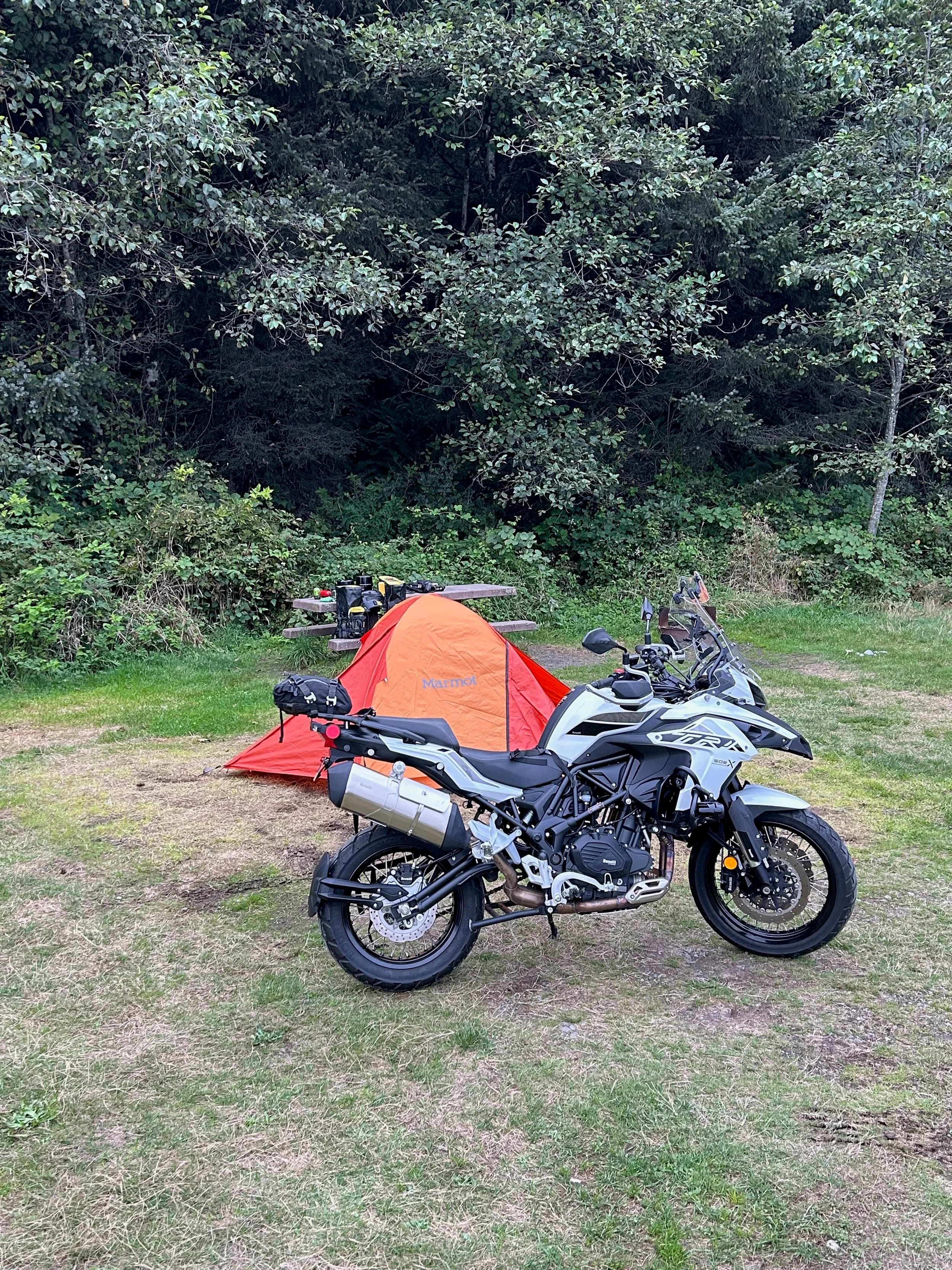 Trip Report: NW National Parks Loop
I left my job recently to take a much needed sabbatical and figure out what I’m doing next. A few weeks after my last day at work I embarked on what was to be a three week tour of NW-ish National Parks from Portland, to include Olympic, North Cascades, Glacier, Yellowstone, Grand Teton, Craters of the Moon, Lassen Volcanic, and Crater Lake.
I ended up missing Grand Tetons due to weather and I had to cut the trip short before I got to Lassen (family medical issue), so Lassen and Crater Lake remain unvisited.
Trip Dates: Sept 3 - Sept 16 (13 days)
Total Travel Miles: 3478 (does not include local miles for store runs, etc.)
Total Gallons of Gas Used: 82
Equipment: 2021 Benelli TRK502X Gaia GPS & Google Maps running on Sonim XP8 rugged Android phoneButler Motorcycle Maps (paper maps of best M/C roads in the country) iPhone 14 (main camera) Akaso Brave 7 helmet-mounted adventure camera Spot X satellite communicator and tracker Wolfman Luggage WP waterproof tank bag and saddle bags (no longer available) Watershed Colorado dry bag duffel (across the pillion seat) Kriega US-5 Drypack (tail bag) Kriega 3L hydration backpack (strapped to duffel, not worn)Marmot Ajax 2 tent Nemo hydrophobic down sleeping bag (non-mummy)Helinox ultralight cot MSR WhisperLite International stove
(Purchased in 1991 for my first moto trip: Detroit, MI to San Diego and back on an XT250)Gossamer Gear Bare Boxer bear-proof food canisters (two - one in each saddle bag)
Day 1 - Olympic National Park Date: Tuesday 9/3/2024
Destination: South Beach Campground, Olympic National Park
Travel Time: 4h 24m
Miles: 213Notes:
Planned to head west to Astoria then north from there, but left later than expected so headed up I-5 to US 12. I’ve driven/ridden that stretch of I-5 hundreds of times (starting in 1993). It’s boring and I hate it.
South Beach CG is first-come-first-served. I didn’t have issue getting a site. There is a long, tight loop of sites along the coastline, but I chose one of the sites further back near the bathrooms due to wind concerns. The bathroom building provided a sort of wind shelter for my site.
I used the heated grips on this leg; it was pretty chilly along the coast in the Olympic Peninsula. I almost didn’t install them, thinking I was being paranoid about the cold. I ended up using them a lot.
Day 2 - Ferry to Seattle / Burien Date: Wednesday 9/4/2024
Destination: Friend’s house in Burien, WA
Travel Time: 7h 30m
Miles: 199
Notes:
Slept well (thanks to Advil PM). I’ve not been sleeping well for more than a year. I’m really hoping to reset my sleep patterns with this trip. A good night’s sleep is one of my great joys and I feel like I’ve been robbed of that pleasure.
Used my Aeropress this morning for the first time ever. I’m hooked.
Headed up along US 101 through Port Angeles and then down to the Southworth ferry terminal near Port Orchard. Ferried across to Fauntleroy, which is just a few miles north my friend’s house in Burien. I’m always surprised at how long it takes to get from the Olympic Peninsula to the east side of Puget Sound (Seattle, etc.). With the ferry crossing (I love ferries) it took seven and a half hours to go 200 miles.
Discovered at my first stop of the day (just up 101 at the Kalaloch Campground, stopped to refill water) that the battery is quite weak and won’t start the bike if you leave the ignition on for even two minutes without the motor running. This would become a theme for the next few days. Fortunately, I have a jumper box and a permanent jump harness wired to the battery so jump starts are a quick operation.
Had a good evening with old friends.
Day 3 - North Cascades via Mountain Loop RoadDate: Thursday 9/5/2024
Destination: Newhalem Campground, North Cascades National Park
Travel Time: 4h 30m
Miles: 146Notes:
Slept well, on the couch. No pills needed.
I realized yesterday that my summer riding gloves (Rev’It Dune) were a size (or two) too small. Rev’It gloves fit really tight and I feel like I can never get it quite right. And yet, I love them. So, I stopped at a Cycle Gear in Bellevue to pick up something summer weight (Dirt 3) that fit better. They’re better, but maybe still one size too small. Such is life.
From Bellevue, I rode north and took the Mountain Loop Hwy then on up north to North Cascades. It was a hot ride. Still summer.
A small section of the Mountain Loop Road is dirt/gravel, which I didn’t realize. No biggie. Was just surprised (clearly I didn’t study my maps closely enough). When riding solo on a bike that weighs over 500 lbs., I tend to avoid planning much off-pavement riding. That’s what my DR-Z is for.
Day 4 - Newport, Washington via Winthrop Date: Friday 9/6/2024
Destination: Golden Spur Motor Inn, Newport, Washington
Travel Time: 8h
Miles: 308
Notes:
Slept just ok, even with Advil PM.
Pretty ride through North Cascades National Park and Colville National Forest. Didn’t do any backroads or hikes. Discovered (new to me) the town of Winthrop. Stopped for coffee at Sheri’s and resupplied on freeze-dried food at Cascades Outdoor Store.
The town of Newport is almost nothing, but, inexplicably, there’s an amazing restaurant (Brownell’s Place). Had dinner and a few ciders. Met and chatted with the owner/chef (she’s great). Listened to some live music. Then back to the motel.
Day 5 - New Battery in Kalispell Date: Saturday 9/7/2024
Destination: West Glacier KOA, West Glacier, MT
Travel Time: 8h 7m
Miles: 293
Notes:
Slept well on motel bed (on sleeping bag, not in the sheets). Another hot one.
Discovered that the water pump seal leaks oil. A quick post in the TRK Facebook group revealed that this is a common problem on this bike, and and easy fix. It’s apparently just a bad o-ring.
Battery has been getting continuously worse, and now requires I jump start the bike about every other start. Google Maps to the rescue: directions to the Batteries Plus in Kalispell, please. They don’t have an Odyssey AGM in the right size; the Duracell will have to do. (It’s been great.)
I set up camp at the West Glacier KOA, which will be my base for a few days. KOAs are their own little world. Very strange. Not really my thing, but the on-site laundry was handy.
After setting up camp I opened a cider and used the iPad to book a vehicle reservation for the next day to ride Going to the Sun Road, which I really wanted to do.
Day 6 - Going to the Sun RoadDate: Sunday 9/8/2024
Destination: Local Ride: West Glacier, Going to the Sun Road, Saint Mary, East Glacier
Travel Time: 5h 35m
Miles: 142Notes:
Quick breakfast and gas up in West Glacier before entering Going to the Sun Road.
Going to the Sun Road was stunning. This was the first point in the trip where I had tingles and was giddy at what I was seeing.
Took a very short hike along Saint Mary Lake. Again, I was beside myself with the beauty.
Lunch at the general store in Kiowa.
The rest of the ride back after East Glacier was meh, but I just kept thinking about how amazing what I’d seen in the morning had been.
Dinner at the KOA. Tacos from a cart (ok / not great, and a very weird guacamole) and a few glasses of wine from another cart. I asked about the guac and it turns out they make it in a food processor. Come on, people.
Day 7 - Ride to BozemanDate: Monday 9/9/2024
Destination: Friend’s house in Bozeman, Montana
Travel Time: ~ 8h (Gaia crashed near the end of the trip, but before getting to Bozeman)
Miles: ~ 400Notes:
Slept poorly again. No pills this time. Took some photos of my soft luggage setup to answer some questions in the TRK502X Facebook group. The saddle bags are from Wolfman Luggage, but I don’t think they make this waterproof line anymore. I use a duffel dry bag from Watershed across the top. A heat shield protects the side bag from exhaust heat.
Hazy, smoky ride most of the way. Very windy in places. This is where I first really started to feel how underpowered the TRK502 is. Really struggled in places.
Developed an engine-speed-sensitive squeak or rattle. Sounds like when a heat shield vibrates in resonance with engine vibration. Discovered that it’s a missing crash bar mounting bolt allowing the crash bar to rub against the frame.
Also noticed that there’s a resonant oscillation at speed that feels like the chain going bad (like it’s stretching unevenly).
First of several nights at a friend’s house in Bozeman (which, it turns out, is a pretty cool town). And there’s a hot tub…
Day 8 - Bike Maintenance & Hyalite ReservoirDate: Tuesday 9/10/2024
Destination: Local Ride: Hyalite Reservoir
Travel Time: not recorded
Miles: not recordedNotes:
Woke up to a smoky sunrise. I had the best night’s sleep I’ve had in years. This is was the whole point of this trip: to untangle my burnout and reclaim sleep as one of my joys. I wrote about it in my journal when I woke up. I hope this wasn’t a fluke.
Planned to replace the bolt that rattled loose from the crash bar, but instead discovered that it had actually severed off at the mount point. No fixing that on the road. Adjusted chain and moved on.
Lunch at Mountains Walking Brewery in Bozeman.
Rode up to Hyalite Reservoir. Pretty ride. Smoky still.
Soaked in hot tub after dinner.
Day 9 - North Yellowstone LoopDate: Wednesday 9/11/2024
Destination: Northern loop through Yellowstone National Park
Travel Time: 9h 36m
Miles: 272Notes:
Did a day trip from Bozeman down through the northern loop in Yellowstone, entering at Mammoth and taking the scenic route through Paradise Valley.
Saw elk, coyotes (I think), buffalo, and pronghorn.
Pretty ride, but cold in places. Used heated grips again.
Rode the loop through Mammoth Hot Springs (see video) at the end.
Coffee at Tumbleweed Bookstore & Cafe in Gardiner. I kind of dig Gardiner. Good vibe.
Had dinner at Mountains Walking Brewing. Rain and wind started. Lights flickered. Waited for rain to stop before riding back to the house.
Power out at the house due to high winds. This does not bode well for tomorrow.
Day 10 - Winter Weather in the ParksDate: Thursday 9/12/2024
Destination: Grand Teton National Park via West Yellowstone Pocatello, Idaho
Travel Time: 5h 40m
Miles: 201Notes:
Today was supposed to be a gorgeous ride through Yellowstone into Grand Teton National Park, and camping at Signal Mountain CG in the park. The weather had other ideas. It was pouring rain (and cold) all the way to West Yellowstone from Bozeman. By the time I got to West Yellowstone I was getting severe winter weather warnings on my phone calling for up to 3 (three!!) inches of snow accumulating in the high passes in the park. It’s bad enough in a car, but that’s a disaster waiting to happen on a motorcycle.
I parked my butt at Mountain Mama’s Cafe in West Yellowstone to warm up / dry off and decide what to do. I almost had myself convinced to push through when I realized that, even if I made it to the campground ok, I’d be setting up camp in the rain and I’d likely be miserable all night. Grand Teton would have to wait.
From West Yellowstone it’s easy to bail west into Idaho and get away from the park weather and elevations. So that’s what I did. It was not a pleasant ride, though. I was in torrential downpours all the way to Idaho Falls.
Arriving in Idaho Falls, I was exhausted and sure I could just find a room for the night. I dropped the bike at a roundabout (short-legged it coming to a stop; I knew it was going so I just rolled away). Guy behind me helped me pick it up. Then, there were no rooms because it was move in week for the two universities there (U of I, ISU). This would become a recurring theme.
I rode further to Blackfoot. Still no rooms.
I called ahead to Pocatello and got a room at a Red Lion there. I was never so happy to be off the bike.
No pictures this day. I couldn’t even get the action camera to turn on.
Day 11 - Craters of the Moon and EBR-1Date: Friday 9/13/2024
Destination: Craters of the Moon National Monument
Travel Time: 4h 20m
Miles: 124
Notes:
I wasn’t sure what my destination would be today but my plan was to do a little nuclear tourism, see Craters of the Moon, and then go somewhere from there. My schedule and day-plan was thrown off by missing Grand Teton National Park and spending a night in Pocatello, which was not on the itinerary at all.
Stopped in Atomic City. Not sure why; I was under the impression that Atomic City was the first city lit by nuclear engergy, but it was practically a ghost town. There are a few houses there, but as far as I could tell all of the business were shuttered. Except, maybe, for the race track; that looked like it might still get used.
Arco, it turns out, is the city celebrated as the first in the world to be lit by nuclear energy. Nothing special about the town, but they do a nice job of making City Hall photo-worthy.
Between Atomic City and Arco is EBR-1 (Experimental Breeder Reactor I) which was the world’s first breeder reactor. The EBR-1 exhibit was closed for the season, but in the lot next to it were some really interesting experimental nuclear heat-transfer jet engines that never made it out of the experimental phase (probably a good thing).
Craters of the Moon is pretty small. If you don’t do any of the walks, it’s literally just a 30 minute road loop. Still, it was an unexpected surprise and delight. I had no idea what to expect but I was positively chuffed at the experience. I noticed that the campground had open sites so I inquired at the entry booth. As luck would have it, the whole campground is first come / first serve. I decided to set up for the night. It’s good to be done early and have some time to read and not stress about making distance.
Day 12 - New Chain in Twin FallsDate: Saturday 9/14/2024
Destination: Battle Mountain, Nevada
Travel Time: 8h 52m
Miles: 335
Notes:
Beautiful morning in Craters of the Moon. While I was breaking camp a parade of classic cars came into the park to drive the loop. I got a picture of one Pontiac down the road in Carey at a gas station.
Carey ended up being an unplanned fork in the road for me. I discovered this morning that my chain was indeed stretching unevenly, and the oscillation I was feeling and hearing was the chain hum changing from a “loose” hum to a “tight” hum rapidly as the tight spot moved around the sprockets. I was supposed to continue west to Mountain Home and then south from there into Nevada. A very scenic route, according to my Butler map. But, between camp and the gas station I got pretty paranoid about the chain snapping at high speed, which, worst case, could lead to a fatal crash.
So I called ahead to a few motorcycle dealers in Mountain Home (on my planned route) to see if they could take me in and replace the chain. No dice. This is the downside of having an obscure motorcycle from an obscure marque - no one wants to work on it. Making matters worse this is an Italian-designed bike built in China, a fact which causes many people to lose the ability to think clearly. “It’s Chinese junk!” Not so. Next.
With Mountain Home out, I tried Twin Falls. My first call was to Adventure Motorsports, and the service manager there took me in with no hesitation. “How soon can you be here?” I didn’t get his name, but my hat’s off to him and his one tech working furiously on a Saturday to beat the 3pm closing time. He said during high season, they get about 15-20 out of town travelers per week who need something done, and they take them all in. I love to hear stuff like this. This shop is in it for the community. They have a nice showroom, too.
With a quality new chain installed, I got a burrito and a MexiCoke at a Mexican place and went on my way. I made it to Battle Mountain, NV, where I decide to get a room. Tomorrow I rejoin my planned scenic route. Day 13 - Desert Mountains in NV, CADate: Sunday 9/15/2024
Destination: Grizzly Campground, Lake Davis (near Portola, CA)
Travel Time: 7h
Miles: 307
Notes:
I love the northern Nevada landscape, and today’s ride didn’t disappoint. US Highway 50 is apparently known as “The Loneliest Highway” but everyone knows about it, so it’s not very lonely. However, after leaving Austin, NV headed west you can take Nevada Highway 722, which dips to the south and follows the old US 50 route. It was completely empty and the twisties through the passes were fun. Highly recommended.
Stopped in Fallon for gas and to find a Micro SD card for the action camera. Walmart to the rescue.
After Reno, I crossed into California and, I swear, it looks different. Norther California desert mountains are so beautiful.
Camped at a nearly empty campground on Lake Davis (very end of the season). The host warned me rain was coming tomorrow.
Day 14 - Unplanned Return HomeDate: Monday 9/16/2024
Destination: Summit Lake Campground, Lassen Volcanic National Park Portland, Oregon (Home)
Travel Time: 10h 32m
Miles: 538Notes:
Last week, my mom went into the hospital for a fairly routine procedure. My brother went to Michigan to help out, as needed, and he went back home to Arizona after she returned home and everything seemed settled.
This morning, while having coffee, I got a call that she’d gone back into the hospital with something that may or may not have been related to the procedure. It seemed like maybe things were ok, but maybe not.
I decided the best thing to do was head home so that I was near an airport if I needed to fly out to Michigan to help out.
I packed up camp and headed up US 395 toward home, via Klamath Falls. It was a pretty ride, but, once again, I found myself in rain most of the way to Klamath Falls.
I was pretty beat by the time I got to Klamath Falls and figured I’d just find a hotel room, get a hot shower, and finish the ride tomorrow.
But, once again, it was move-in week for the local university. Holiday Inn Express had a single room for $395. No thanks. Onward.
I never hit rain again after Klamath Falls, and after turning west onto Oregon Hwy 58 and starting to lose elevation into the Willamette Valley, the temperature starting rising, which was welcome.
Once I reached Eugene, there was no point in not just going all the way home, so that’s what I did.
I got two pictures: one at camp before the call, and one at my last gas stop, an hour and twenty minutes from home, with the moon rising.
A nice side effect of my early return home is that I was home for my birthday (tomorrow), so I had dinner with my kids and my wife, which was lovely.
I did end up flying to Michigan the next day, and was there for a bit. The best part? I got to make some meals for my mom and step dad. Everything seems ok with my mom for now.
Grand Teton, Lassen, and Crater Lake will be there, and now I have an excuse for another trip in the future.