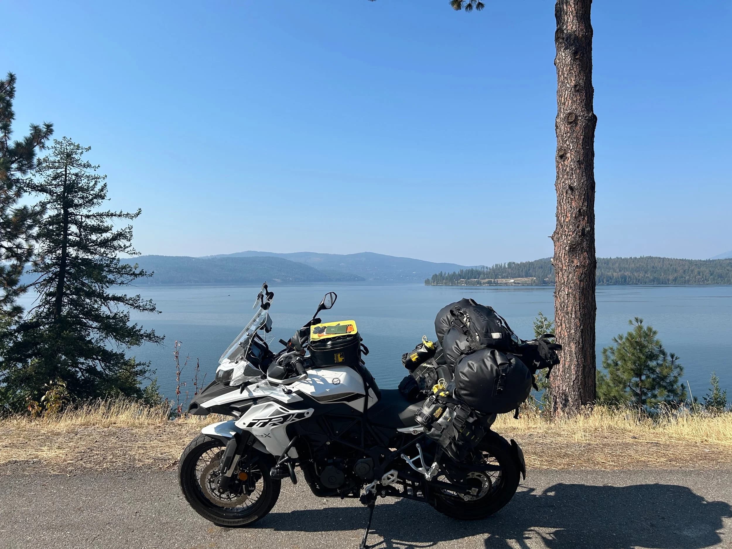 Trip Report: NW National Parks Loop
I left my job recently to take a much needed sabbatical and figure out what I’m doing next. A few weeks after my last day at work I embarked on what was to be a three week tour of NW-ish National Parks from Portland, to include Olympic, North Cascades, Glacier, Yellowstone, Grand Teton, Craters of the Moon, Lassen Volcanic, and Crater Lake.
I ended up missing Grand Tetons due to weather and I had to cut the trip short before I got to Lassen (family medical issue), so Lassen and Crater Lake remain unvisited.
Trip Dates: Sept 3 - Sept 16 (13 days)
Total Travel Miles: 3478 (does not include local miles for store runs, etc.)
Total Gallons of Gas Used: 82
Equipment: 2021 Benelli TRK502X Gaia GPS & Google Maps running on Sonim XP8 rugged Android phoneButler Motorcycle Maps (paper maps of best M/C roads in the country) iPhone 14 (main camera) Akaso Brave 7 helmet-mounted adventure camera Spot X satellite communicator and tracker Wolfman Luggage WP waterproof tank bag and saddle bags (no longer available) Watershed Colorado dry bag duffel (across the pillion seat) Kriega US-5 Drypack (tail bag) Kriega 3L hydration backpack (strapped to duffel, not worn)Marmot Ajax 2 tent Nemo hydrophobic down sleeping bag (non-mummy)Helinox ultralight cot MSR WhisperLite International stove
(Purchased in 1991 for my first moto trip: Detroit, MI to San Diego and back on an XT250)Gossamer Gear Bare Boxer bear-proof food canisters (two - one in each saddle bag)
Day 1 - Olympic National Park Date: Tuesday 9/3/2024
Destination: South Beach Campground, Olympic National Park
Travel Time: 4h 24m
Miles: 213Notes:
Planned to head west to Astoria then north from there, but left later than expected so headed up I-5 to US 12. I’ve driven/ridden that stretch of I-5 hundreds of times (starting in 1993). It’s boring and I hate it.
South Beach CG is first-come-first-served. I didn’t have issue getting a site. There is a long, tight loop of sites along the coastline, but I chose one of the sites further back near the bathrooms due to wind concerns. The bathroom building provided a sort of wind shelter for my site.
I used the heated grips on this leg; it was pretty chilly along the coast in the Olympic Peninsula. I almost didn’t install them, thinking I was being paranoid about the cold. I ended up using them a lot.
Day 2 - Ferry to Seattle / Burien Date: Wednesday 9/4/2024
Destination: Friend’s house in Burien, WA
Travel Time: 7h 30m
Miles: 199
Notes:
Slept well (thanks to Advil PM). I’ve not been sleeping well for more than a year. I’m really hoping to reset my sleep patterns with this trip. A good night’s sleep is one of my great joys and I feel like I’ve been robbed of that pleasure.
Used my Aeropress this morning for the first time ever. I’m hooked.
Headed up along US 101 through Port Angeles and then down to the Southworth ferry terminal near Port Orchard. Ferried across to Fauntleroy, which is just a few miles north my friend’s house in Burien. I’m always surprised at how long it takes to get from the Olympic Peninsula to the east side of Puget Sound (Seattle, etc.). With the ferry crossing (I love ferries) it took seven and a half hours to go 200 miles.
Discovered at my first stop of the day (just up 101 at the Kalaloch Campground, stopped to refill water) that the battery is quite weak and won’t start the bike if you leave the ignition on for even two minutes without the motor running. This would become a theme for the next few days. Fortunately, I have a jumper box and a permanent jump harness wired to the battery so jump starts are a quick operation.
Had a good evening with old friends.
Day 3 - North Cascades via Mountain Loop RoadDate: Thursday 9/5/2024
Destination: Newhalem Campground, North Cascades National Park
Travel Time: 4h 30m
Miles: 146Notes:
Slept well, on the couch. No pills needed.
I realized yesterday that my summer riding gloves (Rev’It Dune) were a size (or two) too small. Rev’It gloves fit really tight and I feel like I can never get it quite right. And yet, I love them. So, I stopped at a Cycle Gear in Bellevue to pick up something summer weight (Dirt 3) that fit better. They’re better, but maybe still one size too small. Such is life.
From Bellevue, I rode north and took the Mountain Loop Hwy then on up north to North Cascades. It was a hot ride. Still summer.
A small section of the Mountain Loop Road is dirt/gravel, which I didn’t realize. No biggie. Was just surprised (clearly I didn’t study my maps closely enough). When riding solo on a bike that weighs over 500 lbs., I tend to avoid planning much off-pavement riding. That’s what my DR-Z is for.
Day 4 - Newport, Washington via Winthrop Date: Friday 9/6/2024
Destination: Golden Spur Motor Inn, Newport, Washington
Travel Time: 8h
Miles: 308
Notes:
Slept just ok, even with Advil PM.
Pretty ride through North Cascades National Park and Colville National Forest. Didn’t do any backroads or hikes. Discovered (new to me) the town of Winthrop. Stopped for coffee at Sheri’s and resupplied on freeze-dried food at Cascades Outdoor Store.
The town of Newport is almost nothing, but, inexplicably, there’s an amazing restaurant (Brownell’s Place). Had dinner and a few ciders. Met and chatted with the owner/chef (she’s great). Listened to some live music. Then back to the motel.
Day 5 - New Battery in Kalispell Date: Saturday 9/7/2024
Destination: West Glacier KOA, West Glacier, MT
Travel Time: 8h 7m
Miles: 293
Notes:
Slept well on motel bed (on sleeping bag, not in the sheets). Another hot one.
Discovered that the water pump seal leaks oil. A quick post in the TRK Facebook group revealed that this is a common problem on this bike, and and easy fix. It’s apparently just a bad o-ring.
Battery has been getting continuously worse, and now requires I jump start the bike about every other start. Google Maps to the rescue: directions to the Batteries Plus in Kalispell, please. They don’t have an Odyssey AGM in the right size; the Duracell will have to do. (It’s been great.)
I set up camp at the West Glacier KOA, which will be my base for a few days. KOAs are their own little world. Very strange. Not really my thing, but the on-site laundry was handy.
After setting up camp I opened a cider and used the iPad to book a vehicle reservation for the next day to ride Going to the Sun Road, which I really wanted to do.
Day 6 - Going to the Sun RoadDate: Sunday 9/8/2024
Destination: Local Ride: West Glacier, Going to the Sun Road, Saint Mary, East Glacier
Travel Time: 5h 35m
Miles: 142Notes:
Quick breakfast and gas up in West Glacier before entering Going to the Sun Road.
Going to the Sun Road was stunning. This was the first point in the trip where I had tingles and was giddy at what I was seeing.
Took a very short hike along Saint Mary Lake. Again, I was beside myself with the beauty.
Lunch at the general store in Kiowa.
The rest of the ride back after East Glacier was meh, but I just kept thinking about how amazing what I’d seen in the morning had been.
Dinner at the KOA. Tacos from a cart (ok / not great, and a very weird guacamole) and a few glasses of wine from another cart. I asked about the guac and it turns out they make it in a food processor. Come on, people.
Day 7 - Ride to BozemanDate: Monday 9/9/2024
Destination: Friend’s house in Bozeman, Montana
Travel Time: ~ 8h (Gaia crashed near the end of the trip, but before getting to Bozeman)
Miles: ~ 400Notes:
Slept poorly again. No pills this time. Took some photos of my soft luggage setup to answer some questions in the TRK502X Facebook group. The saddle bags are from Wolfman Luggage, but I don’t think they make this waterproof line anymore. I use a duffel dry bag from Watershed across the top. A heat shield protects the side bag from exhaust heat.
Hazy, smoky ride most of the way. Very windy in places. This is where I first really started to feel how underpowered the TRK502 is. Really struggled in places.
Developed an engine-speed-sensitive squeak or rattle. Sounds like when a heat shield vibrates in resonance with engine vibration. Discovered that it’s a missing crash bar mounting bolt allowing the crash bar to rub against the frame.
Also noticed that there’s a resonant oscillation at speed that feels like the chain going bad (like it’s stretching unevenly).
First of several nights at a friend’s house in Bozeman (which, it turns out, is a pretty cool town). And there’s a hot tub…
Day 8 - Bike Maintenance & Hyalite ReservoirDate: Tuesday 9/10/2024
Destination: Local Ride: Hyalite Reservoir
Travel Time: not recorded
Miles: not recordedNotes:
Woke up to a smoky sunrise. I had the best night’s sleep I’ve had in years. This is was the whole point of this trip: to untangle my burnout and reclaim sleep as one of my joys. I wrote about it in my journal when I woke up. I hope this wasn’t a fluke.
Planned to replace the bolt that rattled loose from the crash bar, but instead discovered that it had actually severed off at the mount point. No fixing that on the road. Adjusted chain and moved on.
Lunch at Mountains Walking Brewery in Bozeman.
Rode up to Hyalite Reservoir. Pretty ride. Smoky still.
Soaked in hot tub after dinner.
Day 9 - North Yellowstone LoopDate: Wednesday 9/11/2024
Destination: Northern loop through Yellowstone National Park
Travel Time: 9h 36m
Miles: 272Notes:
Did a day trip from Bozeman down through the northern loop in Yellowstone, entering at Mammoth and taking the scenic route through Paradise Valley.
Saw elk, coyotes (I think), buffalo, and pronghorn.
Pretty ride, but cold in places. Used heated grips again.
Rode the loop through Mammoth Hot Springs (see video) at the end.
Coffee at Tumbleweed Bookstore & Cafe in Gardiner. I kind of dig Gardiner. Good vibe.
Had dinner at Mountains Walking Brewing. Rain and wind started. Lights flickered. Waited for rain to stop before riding back to the house.
Power out at the house due to high winds. This does not bode well for tomorrow.
Day 10 - Winter Weather in the ParksDate: Thursday 9/12/2024
Destination: Grand Teton National Park via West Yellowstone Pocatello, Idaho
Travel Time: 5h 40m
Miles: 201Notes:
Today was supposed to be a gorgeous ride through Yellowstone into Grand Teton National Park, and camping at Signal Mountain CG in the park. The weather had other ideas. It was pouring rain (and cold) all the way to West Yellowstone from Bozeman. By the time I got to West Yellowstone I was getting severe winter weather warnings on my phone calling for up to 3 (three!!) inches of snow accumulating in the high passes in the park. It’s bad enough in a car, but that’s a disaster waiting to happen on a motorcycle.
I parked my butt at Mountain Mama’s Cafe in West Yellowstone to warm up / dry off and decide what to do. I almost had myself convinced to push through when I realized that, even if I made it to the campground ok, I’d be setting up camp in the rain and I’d likely be miserable all night. Grand Teton would have to wait.
From West Yellowstone it’s easy to bail west into Idaho and get away from the park weather and elevations. So that’s what I did. It was not a pleasant ride, though. I was in torrential downpours all the way to Idaho Falls.
Arriving in Idaho Falls, I was exhausted and sure I could just find a room for the night. I dropped the bike at a roundabout (short-legged it coming to a stop; I knew it was going so I just rolled away). Guy behind me helped me pick it up. Then, there were no rooms because it was move in week for the two universities there (U of I, ISU). This would become a recurring theme.
I rode further to Blackfoot. Still no rooms.
I called ahead to Pocatello and got a room at a Red Lion there. I was never so happy to be off the bike.
No pictures this day. I couldn’t even get the action camera to turn on.
Day 11 - Craters of the Moon and EBR-1Date: Friday 9/13/2024
Destination: Craters of the Moon National Monument
Travel Time: 4h 20m
Miles: 124
Notes:
I wasn’t sure what my destination would be today but my plan was to do a little nuclear tourism, see Craters of the Moon, and then go somewhere from there. My schedule and day-plan was thrown off by missing Grand Teton National Park and spending a night in Pocatello, which was not on the itinerary at all.
Stopped in Atomic City. Not sure why; I was under the impression that Atomic City was the first city lit by nuclear engergy, but it was practically a ghost town. There are a few houses there, but as far as I could tell all of the business were shuttered. Except, maybe, for the race track; that looked like it might still get used.
Arco, it turns out, is the city celebrated as the first in the world to be lit by nuclear energy. Nothing special about the town, but they do a nice job of making City Hall photo-worthy.
Between Atomic City and Arco is EBR-1 (Experimental Breeder Reactor I) which was the world’s first breeder reactor. The EBR-1 exhibit was closed for the season, but in the lot next to it were some really interesting experimental nuclear heat-transfer jet engines that never made it out of the experimental phase (probably a good thing).
Craters of the Moon is pretty small. If you don’t do any of the walks, it’s literally just a 30 minute road loop. Still, it was an unexpected surprise and delight. I had no idea what to expect but I was positively chuffed at the experience. I noticed that the campground had open sites so I inquired at the entry booth. As luck would have it, the whole campground is first come / first serve. I decided to set up for the night. It’s good to be done early and have some time to read and not stress about making distance.
Day 12 - New Chain in Twin FallsDate: Saturday 9/14/2024
Destination: Battle Mountain, Nevada
Travel Time: 8h 52m
Miles: 335
Notes:
Beautiful morning in Craters of the Moon. While I was breaking camp a parade of classic cars came into the park to drive the loop. I got a picture of one Pontiac down the road in Carey at a gas station.
Carey ended up being an unplanned fork in the road for me. I discovered this morning that my chain was indeed stretching unevenly, and the oscillation I was feeling and hearing was the chain hum changing from a “loose” hum to a “tight” hum rapidly as the tight spot moved around the sprockets. I was supposed to continue west to Mountain Home and then south from there into Nevada. A very scenic route, according to my Butler map. But, between camp and the gas station I got pretty paranoid about the chain snapping at high speed, which, worst case, could lead to a fatal crash.
So I called ahead to a few motorcycle dealers in Mountain Home (on my planned route) to see if they could take me in and replace the chain. No dice. This is the downside of having an obscure motorcycle from an obscure marque - no one wants to work on it. Making matters worse this is an Italian-designed bike built in China, a fact which causes many people to lose the ability to think clearly. “It’s Chinese junk!” Not so. Next.
With Mountain Home out, I tried Twin Falls. My first call was to Adventure Motorsports, and the service manager there took me in with no hesitation. “How soon can you be here?” I didn’t get his name, but my hat’s off to him and his one tech working furiously on a Saturday to beat the 3pm closing time. He said during high season, they get about 15-20 out of town travelers per week who need something done, and they take them all in. I love to hear stuff like this. This shop is in it for the community. They have a nice showroom, too.
With a quality new chain installed, I got a burrito and a MexiCoke at a Mexican place and went on my way. I made it to Battle Mountain, NV, where I decide to get a room. Tomorrow I rejoin my planned scenic route. Day 13 - Desert Mountains in NV, CADate: Sunday 9/15/2024
Destination: Grizzly Campground, Lake Davis (near Portola, CA)
Travel Time: 7h
Miles: 307
Notes:
I love the northern Nevada landscape, and today’s ride didn’t disappoint. US Highway 50 is apparently known as “The Loneliest Highway” but everyone knows about it, so it’s not very lonely. However, after leaving Austin, NV headed west you can take Nevada Highway 722, which dips to the south and follows the old US 50 route. It was completely empty and the twisties through the passes were fun. Highly recommended.
Stopped in Fallon for gas and to find a Micro SD card for the action camera. Walmart to the rescue.
After Reno, I crossed into California and, I swear, it looks different. Norther California desert mountains are so beautiful.
Camped at a nearly empty campground on Lake Davis (very end of the season). The host warned me rain was coming tomorrow.
Day 14 - Unplanned Return HomeDate: Monday 9/16/2024
Destination: Summit Lake Campground, Lassen Volcanic National Park Portland, Oregon (Home)
Travel Time: 10h 32m
Miles: 538Notes:
Last week, my mom went into the hospital for a fairly routine procedure. My brother went to Michigan to help out, as needed, and he went back home to Arizona after she returned home and everything seemed settled.
This morning, while having coffee, I got a call that she’d gone back into the hospital with something that may or may not have been related to the procedure. It seemed like maybe things were ok, but maybe not.
I decided the best thing to do was head home so that I was near an airport if I needed to fly out to Michigan to help out.
I packed up camp and headed up US 395 toward home, via Klamath Falls. It was a pretty ride, but, once again, I found myself in rain most of the way to Klamath Falls.
I was pretty beat by the time I got to Klamath Falls and figured I’d just find a hotel room, get a hot shower, and finish the ride tomorrow.
But, once again, it was move-in week for the local university. Holiday Inn Express had a single room for $395. No thanks. Onward.
I never hit rain again after Klamath Falls, and after turning west onto Oregon Hwy 58 and starting to lose elevation into the Willamette Valley, the temperature starting rising, which was welcome.
Once I reached Eugene, there was no point in not just going all the way home, so that’s what I did.
I got two pictures: one at camp before the call, and one at my last gas stop, an hour and twenty minutes from home, with the moon rising.
A nice side effect of my early return home is that I was home for my birthday (tomorrow), so I had dinner with my kids and my wife, which was lovely.
I did end up flying to Michigan the next day, and was there for a bit. The best part? I got to make some meals for my mom and step dad. Everything seems ok with my mom for now.
Grand Teton, Lassen, and Crater Lake will be there, and now I have an excuse for another trip in the future.