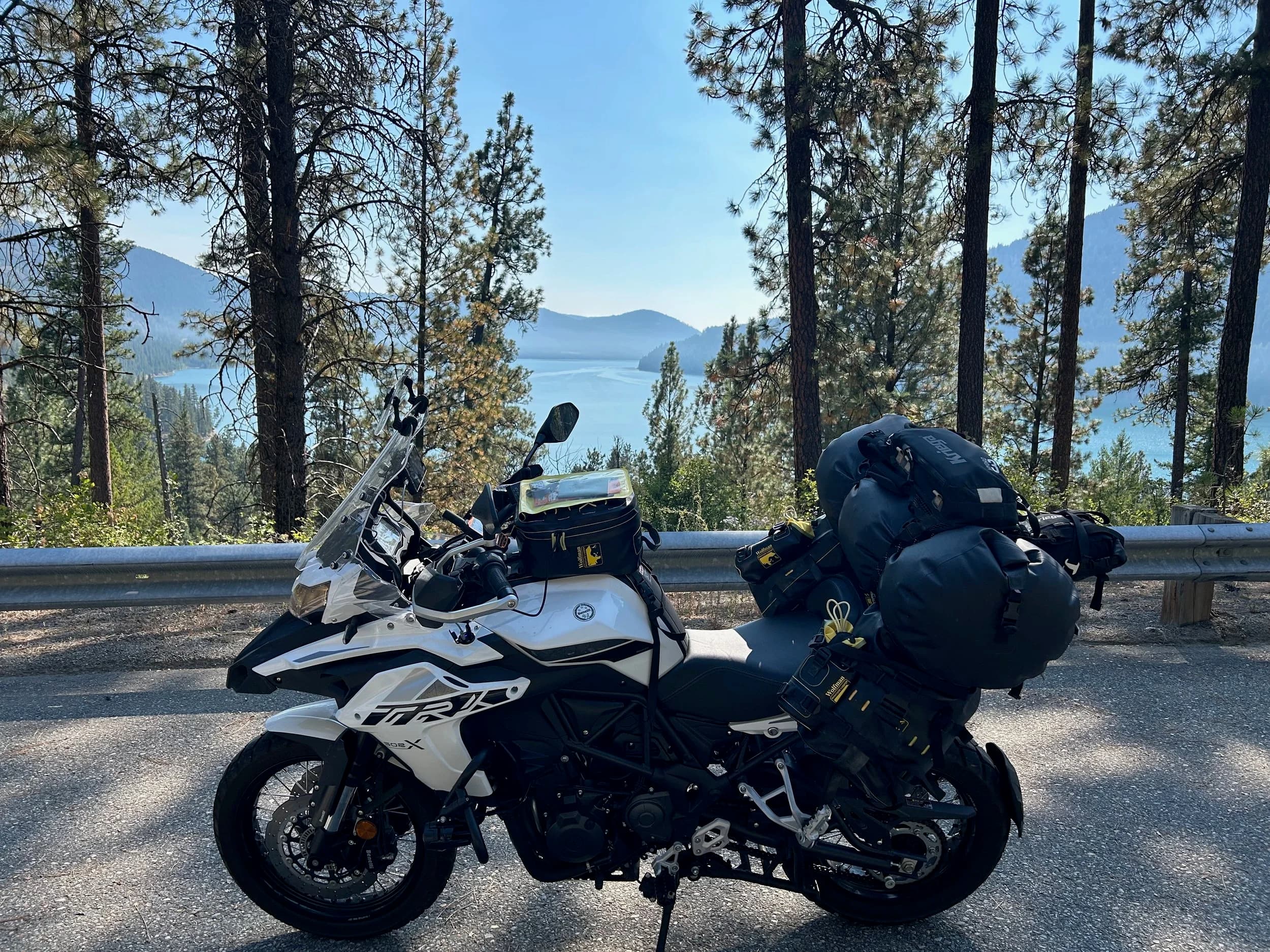 Trip Report: NW National Parks Loop
I left my job recently to take a much needed sabbatical and figure out what I’m doing next. A few weeks after my last day at work I embarked on what was to be a three week tour of NW-ish National Parks from Portland, to include Olympic, North Cascades, Glacier, Yellowstone, Grand Teton, Craters of the Moon, Lassen Volcanic, and Crater Lake.
I ended up missing Grand Tetons due to weather and I had to cut the trip short before I got to Lassen (family medical issue), so Lassen and Crater Lake remain unvisited.
Trip Dates: Sept 3 - Sept 16 (13 days)
Total Travel Miles: 3478 (does not include local miles for store runs, etc.)
Total Gallons of Gas Used: 82
Equipment: 2021 Benelli TRK502X Gaia GPS & Google Maps running on Sonim XP8 rugged Android phoneButler Motorcycle Maps (paper maps of best M/C roads in the country) iPhone 14 (main camera) Akaso Brave 7 helmet-mounted adventure camera Spot X satellite communicator and tracker Wolfman Luggage WP waterproof tank bag and saddle bags (no longer available) Watershed Colorado dry bag duffel (across the pillion seat) Kriega US-5 Drypack (tail bag) Kriega 3L hydration backpack (strapped to duffel, not worn)Marmot Ajax 2 tent Nemo hydrophobic down sleeping bag (non-mummy)Helinox ultralight cot MSR WhisperLite International stove
(Purchased in 1991 for my first moto trip: Detroit, MI to San Diego and back on an XT250)Gossamer Gear Bare Boxer bear-proof food canisters (two - one in each saddle bag)
Day 1 - Olympic National Park Date: Tuesday 9/3/2024
Destination: South Beach Campground, Olympic National Park
Travel Time: 4h 24m
Miles: 213Notes:
Planned to head west to Astoria then north from there, but left later than expected so headed up I-5 to US 12. I’ve driven/ridden that stretch of I-5 hundreds of times (starting in 1993). It’s boring and I hate it.
South Beach CG is first-come-first-served. I didn’t have issue getting a site. There is a long, tight loop of sites along the coastline, but I chose one of the sites further back near the bathrooms due to wind concerns. The bathroom building provided a sort of wind shelter for my site.
I used the heated grips on this leg; it was pretty chilly along the coast in the Olympic Peninsula. I almost didn’t install them, thinking I was being paranoid about the cold. I ended up using them a lot.
Day 2 - Ferry to Seattle / Burien Date: Wednesday 9/4/2024
Destination: Friend’s house in Burien, WA
Travel Time: 7h 30m
Miles: 199
Notes:
Slept well (thanks to Advil PM). I’ve not been sleeping well for more than a year. I’m really hoping to reset my sleep patterns with this trip. A good night’s sleep is one of my great joys and I feel like I’ve been robbed of that pleasure.
Used my Aeropress this morning for the first time ever. I’m hooked.
Headed up along US 101 through Port Angeles and then down to the Southworth ferry terminal near Port Orchard. Ferried across to Fauntleroy, which is just a few miles north my friend’s house in Burien. I’m always surprised at how long it takes to get from the Olympic Peninsula to the east side of Puget Sound (Seattle, etc.). With the ferry crossing (I love ferries) it took seven and a half hours to go 200 miles.
Discovered at my first stop of the day (just up 101 at the Kalaloch Campground, stopped to refill water) that the battery is quite weak and won’t start the bike if you leave the ignition on for even two minutes without the motor running. This would become a theme for the next few days. Fortunately, I have a jumper box and a permanent jump harness wired to the battery so jump starts are a quick operation.
Had a good evening with old friends.
Day 3 - North Cascades via Mountain Loop RoadDate: Thursday 9/5/2024
Destination: Newhalem Campground, North Cascades National Park
Travel Time: 4h 30m
Miles: 146Notes:
Slept well, on the couch. No pills needed.
I realized yesterday that my summer riding gloves (Rev’It Dune) were a size (or two) too small. Rev’It gloves fit really tight and I feel like I can never get it quite right. And yet, I love them. So, I stopped at a Cycle Gear in Bellevue to pick up something summer weight (Dirt 3) that fit better. They’re better, but maybe still one size too small. Such is life.
From Bellevue, I rode north and took the Mountain Loop Hwy then on up north to North Cascades. It was a hot ride. Still summer.
A small section of the Mountain Loop Road is dirt/gravel, which I didn’t realize. No biggie. Was just surprised (clearly I didn’t study my maps closely enough). When riding solo on a bike that weighs over 500 lbs., I tend to avoid planning much off-pavement riding. That’s what my DR-Z is for.
Day 4 - Newport, Washington via Winthrop Date: Friday 9/6/2024
Destination: Golden Spur Motor Inn, Newport, Washington
Travel Time: 8h
Miles: 308
Notes:
Slept just ok, even with Advil PM.
Pretty ride through North Cascades National Park and Colville National Forest. Didn’t do any backroads or hikes. Discovered (new to me) the town of Winthrop. Stopped for coffee at Sheri’s and resupplied on freeze-dried food at Cascades Outdoor Store.
The town of Newport is almost nothing, but, inexplicably, there’s an amazing restaurant (Brownell’s Place). Had dinner and a few ciders. Met and chatted with the owner/chef (she’s great). Listened to some live music. Then back to the motel.
Day 5 - New Battery in Kalispell Date: Saturday 9/7/2024
Destination: West Glacier KOA, West Glacier, MT
Travel Time: 8h 7m
Miles: 293
Notes:
Slept well on motel bed (on sleeping bag, not in the sheets). Another hot one.
Discovered that the water pump seal leaks oil. A quick post in the TRK Facebook group revealed that this is a common problem on this bike, and and easy fix. It’s apparently just a bad o-ring.
Battery has been getting continuously worse, and now requires I jump start the bike about every other start. Google Maps to the rescue: directions to the Batteries Plus in Kalispell, please. They don’t have an Odyssey AGM in the right size; the Duracell will have to do. (It’s been great.)
I set up camp at the West Glacier KOA, which will be my base for a few days. KOAs are their own little world. Very strange. Not really my thing, but the on-site laundry was handy.
After setting up camp I opened a cider and used the iPad to book a vehicle reservation for the next day to ride Going to the Sun Road, which I really wanted to do.
Day 6 - Going to the Sun RoadDate: Sunday 9/8/2024
Destination: Local Ride: West Glacier, Going to the Sun Road, Saint Mary, East Glacier
Travel Time: 5h 35m
Miles: 142Notes:
Quick breakfast and gas up in West Glacier before entering Going to the Sun Road.
Going to the Sun Road was stunning. This was the first point in the trip where I had tingles and was giddy at what I was seeing.
Took a very short hike along Saint Mary Lake. Again, I was beside myself with the beauty.
Lunch at the general store in Kiowa.
The rest of the ride back after East Glacier was meh, but I just kept thinking about how amazing what I’d seen in the morning had been.
Dinner at the KOA. Tacos from a cart (ok / not great, and a very weird guacamole) and a few glasses of wine from another cart. I asked about the guac and it turns out they make it in a food processor. Come on, people.
Day 7 - Ride to BozemanDate: Monday 9/9/2024
Destination: Friend’s house in Bozeman, Montana
Travel Time: ~ 8h (Gaia crashed near the end of the trip, but before getting to Bozeman)
Miles: ~ 400Notes:
Slept poorly again. No pills this time. Took some photos of my soft luggage setup to answer some questions in the TRK502X Facebook group. The saddle bags are from Wolfman Luggage, but I don’t think they make this waterproof line anymore. I use a duffel dry bag from Watershed across the top. A heat shield protects the side bag from exhaust heat.
Hazy, smoky ride most of the way. Very windy in places. This is where I first really started to feel how underpowered the TRK502 is. Really struggled in places.
Developed an engine-speed-sensitive squeak or rattle. Sounds like when a heat shield vibrates in resonance with engine vibration. Discovered that it’s a missing crash bar mounting bolt allowing the crash bar to rub against the frame.
Also noticed that there’s a resonant oscillation at speed that feels like the chain going bad (like it’s stretching unevenly).
First of several nights at a friend’s house in Bozeman (which, it turns out, is a pretty cool town). And there’s a hot tub…
Day 8 - Bike Maintenance & Hyalite ReservoirDate: Tuesday 9/10/2024
Destination: Local Ride: Hyalite Reservoir
Travel Time: not recorded
Miles: not recordedNotes:
Woke up to a smoky sunrise. I had the best night’s sleep I’ve had in years. This is was the whole point of this trip: to untangle my burnout and reclaim sleep as one of my joys. I wrote about it in my journal when I woke up. I hope this wasn’t a fluke.
Planned to replace the bolt that rattled loose from the crash bar, but instead discovered that it had actually severed off at the mount point. No fixing that on the road. Adjusted chain and moved on.
Lunch at Mountains Walking Brewery in Bozeman.
Rode up to Hyalite Reservoir. Pretty ride. Smoky still.
Soaked in hot tub after dinner.
Day 9 - North Yellowstone LoopDate: Wednesday 9/11/2024
Destination: Northern loop through Yellowstone National Park
Travel Time: 9h 36m
Miles: 272Notes:
Did a day trip from Bozeman down through the northern loop in Yellowstone, entering at Mammoth and taking the scenic route through Paradise Valley.
Saw elk, coyotes (I think), buffalo, and pronghorn.
Pretty ride, but cold in places. Used heated grips again.
Rode the loop through Mammoth Hot Springs (see video) at the end.
Coffee at Tumbleweed Bookstore & Cafe in Gardiner. I kind of dig Gardiner. Good vibe.
Had dinner at Mountains Walking Brewing. Rain and wind started. Lights flickered. Waited for rain to stop before riding back to the house.
Power out at the house due to high winds. This does not bode well for tomorrow.
Day 10 - Winter Weather in the ParksDate: Thursday 9/12/2024
Destination: Grand Teton National Park via West Yellowstone Pocatello, Idaho
Travel Time: 5h 40m
Miles: 201Notes:
Today was supposed to be a gorgeous ride through Yellowstone into Grand Teton National Park, and camping at Signal Mountain CG in the park. The weather had other ideas. It was pouring rain (and cold) all the way to West Yellowstone from Bozeman. By the time I got to West Yellowstone I was getting severe winter weather warnings on my phone calling for up to 3 (three!!) inches of snow accumulating in the high passes in the park. It’s bad enough in a car, but that’s a disaster waiting to happen on a motorcycle.
I parked my butt at Mountain Mama’s Cafe in West Yellowstone to warm up / dry off and decide what to do. I almost had myself convinced to push through when I realized that, even if I made it to the campground ok, I’d be setting up camp in the rain and I’d likely be miserable all night. Grand Teton would have to wait.
From West Yellowstone it’s easy to bail west into Idaho and get away from the park weather and elevations. So that’s what I did. It was not a pleasant ride, though. I was in torrential downpours all the way to Idaho Falls.
Arriving in Idaho Falls, I was exhausted and sure I could just find a room for the night. I dropped the bike at a roundabout (short-legged it coming to a stop; I knew it was going so I just rolled away). Guy behind me helped me pick it up. Then, there were no rooms because it was move in week for the two universities there (U of I, ISU). This would become a recurring theme.
I rode further to Blackfoot. Still no rooms.
I called ahead to Pocatello and got a room at a Red Lion there. I was never so happy to be off the bike.
No pictures this day. I couldn’t even get the action camera to turn on.
Day 11 - Craters of the Moon and EBR-1Date: Friday 9/13/2024
Destination: Craters of the Moon National Monument
Travel Time: 4h 20m
Miles: 124
Notes:
I wasn’t sure what my destination would be today but my plan was to do a little nuclear tourism, see Craters of the Moon, and then go somewhere from there. My schedule and day-plan was thrown off by missing Grand Teton National Park and spending a night in Pocatello, which was not on the itinerary at all.
Stopped in Atomic City. Not sure why; I was under the impression that Atomic City was the first city lit by nuclear engergy, but it was practically a ghost town. There are a few houses there, but as far as I could tell all of the business were shuttered. Except, maybe, for the race track; that looked like it might still get used.
Arco, it turns out, is the city celebrated as the first in the world to be lit by nuclear energy. Nothing special about the town, but they do a nice job of making City Hall photo-worthy.
Between Atomic City and Arco is EBR-1 (Experimental Breeder Reactor I) which was the world’s first breeder reactor. The EBR-1 exhibit was closed for the season, but in the lot next to it were some really interesting experimental nuclear heat-transfer jet engines that never made it out of the experimental phase (probably a good thing).
Craters of the Moon is pretty small. If you don’t do any of the walks, it’s literally just a 30 minute road loop. Still, it was an unexpected surprise and delight. I had no idea what to expect but I was positively chuffed at the experience. I noticed that the campground had open sites so I inquired at the entry booth. As luck would have it, the whole campground is first come / first serve. I decided to set up for the night. It’s good to be done early and have some time to read and not stress about making distance.
Day 12 - New Chain in Twin FallsDate: Saturday 9/14/2024
Destination: Battle Mountain, Nevada
Travel Time: 8h 52m
Miles: 335
Notes:
Beautiful morning in Craters of the Moon. While I was breaking camp a parade of classic cars came into the park to drive the loop. I got a picture of one Pontiac down the road in Carey at a gas station.
Carey ended up being an unplanned fork in the road for me. I discovered this morning that my chain was indeed stretching unevenly, and the oscillation I was feeling and hearing was the chain hum changing from a “loose” hum to a “tight” hum rapidly as the tight spot moved around the sprockets. I was supposed to continue west to Mountain Home and then south from there into Nevada. A very scenic route, according to my Butler map. But, between camp and the gas station I got pretty paranoid about the chain snapping at high speed, which, worst case, could lead to a fatal crash.
So I called ahead to a few motorcycle dealers in Mountain Home (on my planned route) to see if they could take me in and replace the chain. No dice. This is the downside of having an obscure motorcycle from an obscure marque - no one wants to work on it. Making matters worse this is an Italian-designed bike built in China, a fact which causes many people to lose the ability to think clearly. “It’s Chinese junk!” Not so. Next.
With Mountain Home out, I tried Twin Falls. My first call was to Adventure Motorsports, and the service manager there took me in with no hesitation. “How soon can you be here?” I didn’t get his name, but my hat’s off to him and his one tech working furiously on a Saturday to beat the 3pm closing time. He said during high season, they get about 15-20 out of town travelers per week who need something done, and they take them all in. I love to hear stuff like this. This shop is in it for the community. They have a nice showroom, too.
With a quality new chain installed, I got a burrito and a MexiCoke at a Mexican place and went on my way. I made it to Battle Mountain, NV, where I decide to get a room. Tomorrow I rejoin my planned scenic route. Day 13 - Desert Mountains in NV, CADate: Sunday 9/15/2024
Destination: Grizzly Campground, Lake Davis (near Portola, CA)
Travel Time: 7h
Miles: 307
Notes:
I love the northern Nevada landscape, and today’s ride didn’t disappoint. US Highway 50 is apparently known as “The Loneliest Highway” but everyone knows about it, so it’s not very lonely. However, after leaving Austin, NV headed west you can take Nevada Highway 722, which dips to the south and follows the old US 50 route. It was completely empty and the twisties through the passes were fun. Highly recommended.
Stopped in Fallon for gas and to find a Micro SD card for the action camera. Walmart to the rescue.
After Reno, I crossed into California and, I swear, it looks different. Norther California desert mountains are so beautiful.
Camped at a nearly empty campground on Lake Davis (very end of the season). The host warned me rain was coming tomorrow.
Day 14 - Unplanned Return HomeDate: Monday 9/16/2024
Destination: Summit Lake Campground, Lassen Volcanic National Park Portland, Oregon (Home)
Travel Time: 10h 32m
Miles: 538Notes:
Last week, my mom went into the hospital for a fairly routine procedure. My brother went to Michigan to help out, as needed, and he went back home to Arizona after she returned home and everything seemed settled.
This morning, while having coffee, I got a call that she’d gone back into the hospital with something that may or may not have been related to the procedure. It seemed like maybe things were ok, but maybe not.
I decided the best thing to do was head home so that I was near an airport if I needed to fly out to Michigan to help out.
I packed up camp and headed up US 395 toward home, via Klamath Falls. It was a pretty ride, but, once again, I found myself in rain most of the way to Klamath Falls.
I was pretty beat by the time I got to Klamath Falls and figured I’d just find a hotel room, get a hot shower, and finish the ride tomorrow.
But, once again, it was move-in week for the local university. Holiday Inn Express had a single room for $395. No thanks. Onward.
I never hit rain again after Klamath Falls, and after turning west onto Oregon Hwy 58 and starting to lose elevation into the Willamette Valley, the temperature starting rising, which was welcome.
Once I reached Eugene, there was no point in not just going all the way home, so that’s what I did.
I got two pictures: one at camp before the call, and one at my last gas stop, an hour and twenty minutes from home, with the moon rising.
A nice side effect of my early return home is that I was home for my birthday (tomorrow), so I had dinner with my kids and my wife, which was lovely.
I did end up flying to Michigan the next day, and was there for a bit. The best part? I got to make some meals for my mom and step dad. Everything seems ok with my mom for now.
Grand Teton, Lassen, and Crater Lake will be there, and now I have an excuse for another trip in the future.