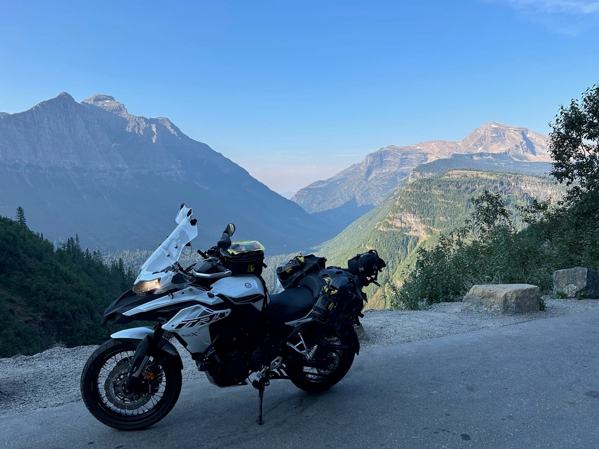 Trip Report: NW National Parks Loop
I left my job recently to take a much needed sabbatical and figure out what I’m doing next. A few weeks after my last day at work I embarked on what was to be a three week tour of NW-ish National Parks from Portland, to include Olympic, North Cascades, Glacier, Yellowstone, Grand Teton, Craters of the Moon, Lassen Volcanic, and Crater Lake.
I ended up missing Grand Tetons due to weather and I had to cut the trip short before I got to Lassen (family medical issue), so Lassen and Crater Lake remain unvisited.
Trip Dates: Sept 3 - Sept 16 (13 days)
Total Travel Miles: 3478 (does not include local miles for store runs, etc.)
Total Gallons of Gas Used: 82
Equipment: 2021 Benelli TRK502X Gaia GPS & Google Maps running on Sonim XP8 rugged Android phoneButler Motorcycle Maps (paper maps of best M/C roads in the country) iPhone 14 (main camera) Akaso Brave 7 helmet-mounted adventure camera Spot X satellite communicator and tracker Wolfman Luggage WP waterproof tank bag and saddle bags (no longer available) Watershed Colorado dry bag duffel (across the pillion seat) Kriega US-5 Drypack (tail bag) Kriega 3L hydration backpack (strapped to duffel, not worn)Marmot Ajax 2 tent Nemo hydrophobic down sleeping bag (non-mummy)Helinox ultralight cot MSR WhisperLite International stove
(Purchased in 1991 for my first moto trip: Detroit, MI to San Diego and back on an XT250)Gossamer Gear Bare Boxer bear-proof food canisters (two - one in each saddle bag)
Day 1 - Olympic National Park Date: Tuesday 9/3/2024
Destination: South Beach Campground, Olympic National Park
Travel Time: 4h 24m
Miles: 213Notes:
Planned to head west to Astoria then north from there, but left later than expected so headed up I-5 to US 12. I’ve driven/ridden that stretch of I-5 hundreds of times (starting in 1993). It’s boring and I hate it.
South Beach CG is first-come-first-served. I didn’t have issue getting a site. There is a long, tight loop of sites along the coastline, but I chose one of the sites further back near the bathrooms due to wind concerns. The bathroom building provided a sort of wind shelter for my site.
I used the heated grips on this leg; it was pretty chilly along the coast in the Olympic Peninsula. I almost didn’t install them, thinking I was being paranoid about the cold. I ended up using them a lot.
Day 2 - Ferry to Seattle / Burien Date: Wednesday 9/4/2024
Destination: Friend’s house in Burien, WA
Travel Time: 7h 30m
Miles: 199
Notes:
Slept well (thanks to Advil PM). I’ve not been sleeping well for more than a year. I’m really hoping to reset my sleep patterns with this trip. A good night’s sleep is one of my great joys and I feel like I’ve been robbed of that pleasure.
Used my Aeropress this morning for the first time ever. I’m hooked.
Headed up along US 101 through Port Angeles and then down to the Southworth ferry terminal near Port Orchard. Ferried across to Fauntleroy, which is just a few miles north my friend’s house in Burien. I’m always surprised at how long it takes to get from the Olympic Peninsula to the east side of Puget Sound (Seattle, etc.). With the ferry crossing (I love ferries) it took seven and a half hours to go 200 miles.
Discovered at my first stop of the day (just up 101 at the Kalaloch Campground, stopped to refill water) that the battery is quite weak and won’t start the bike if you leave the ignition on for even two minutes without the motor running. This would become a theme for the next few days. Fortunately, I have a jumper box and a permanent jump harness wired to the battery so jump starts are a quick operation.
Had a good evening with old friends.
Day 3 - North Cascades via Mountain Loop RoadDate: Thursday 9/5/2024
Destination: Newhalem Campground, North Cascades National Park
Travel Time: 4h 30m
Miles: 146Notes:
Slept well, on the couch. No pills needed.
I realized yesterday that my summer riding gloves (Rev’It Dune) were a size (or two) too small. Rev’It gloves fit really tight and I feel like I can never get it quite right. And yet, I love them. So, I stopped at a Cycle Gear in Bellevue to pick up something summer weight (Dirt 3) that fit better. They’re better, but maybe still one size too small. Such is life.
From Bellevue, I rode north and took the Mountain Loop Hwy then on up north to North Cascades. It was a hot ride. Still summer.
A small section of the Mountain Loop Road is dirt/gravel, which I didn’t realize. No biggie. Was just surprised (clearly I didn’t study my maps closely enough). When riding solo on a bike that weighs over 500 lbs., I tend to avoid planning much off-pavement riding. That’s what my DR-Z is for.
Day 4 - Newport, Washington via Winthrop Date: Friday 9/6/2024
Destination: Golden Spur Motor Inn, Newport, Washington
Travel Time: 8h
Miles: 308
Notes:
Slept just ok, even with Advil PM.
Pretty ride through North Cascades National Park and Colville National Forest. Didn’t do any backroads or hikes. Discovered (new to me) the town of Winthrop. Stopped for coffee at Sheri’s and resupplied on freeze-dried food at Cascades Outdoor Store.
The town of Newport is almost nothing, but, inexplicably, there’s an amazing restaurant (Brownell’s Place). Had dinner and a few ciders. Met and chatted with the owner/chef (she’s great). Listened to some live music. Then back to the motel.
Day 5 - New Battery in Kalispell Date: Saturday 9/7/2024
Destination: West Glacier KOA, West Glacier, MT
Travel Time: 8h 7m
Miles: 293
Notes:
Slept well on motel bed (on sleeping bag, not in the sheets). Another hot one.
Discovered that the water pump seal leaks oil. A quick post in the TRK Facebook group revealed that this is a common problem on this bike, and and easy fix. It’s apparently just a bad o-ring.
Battery has been getting continuously worse, and now requires I jump start the bike about every other start. Google Maps to the rescue: directions to the Batteries Plus in Kalispell, please. They don’t have an Odyssey AGM in the right size; the Duracell will have to do. (It’s been great.)
I set up camp at the West Glacier KOA, which will be my base for a few days. KOAs are their own little world. Very strange. Not really my thing, but the on-site laundry was handy.
After setting up camp I opened a cider and used the iPad to book a vehicle reservation for the next day to ride Going to the Sun Road, which I really wanted to do.
Day 6 - Going to the Sun RoadDate: Sunday 9/8/2024
Destination: Local Ride: West Glacier, Going to the Sun Road, Saint Mary, East Glacier
Travel Time: 5h 35m
Miles: 142Notes:
Quick breakfast and gas up in West Glacier before entering Going to the Sun Road.
Going to the Sun Road was stunning. This was the first point in the trip where I had tingles and was giddy at what I was seeing.
Took a very short hike along Saint Mary Lake. Again, I was beside myself with the beauty.
Lunch at the general store in Kiowa.
The rest of the ride back after East Glacier was meh, but I just kept thinking about how amazing what I’d seen in the morning had been.
Dinner at the KOA. Tacos from a cart (ok / not great, and a very weird guacamole) and a few glasses of wine from another cart. I asked about the guac and it turns out they make it in a food processor. Come on, people.
Day 7 - Ride to BozemanDate: Monday 9/9/2024
Destination: Friend’s house in Bozeman, Montana
Travel Time: ~ 8h (Gaia crashed near the end of the trip, but before getting to Bozeman)
Miles: ~ 400Notes:
Slept poorly again. No pills this time. Took some photos of my soft luggage setup to answer some questions in the TRK502X Facebook group. The saddle bags are from Wolfman Luggage, but I don’t think they make this waterproof line anymore. I use a duffel dry bag from Watershed across the top. A heat shield protects the side bag from exhaust heat.
Hazy, smoky ride most of the way. Very windy in places. This is where I first really started to feel how underpowered the TRK502 is. Really struggled in places.
Developed an engine-speed-sensitive squeak or rattle. Sounds like when a heat shield vibrates in resonance with engine vibration. Discovered that it’s a missing crash bar mounting bolt allowing the crash bar to rub against the frame.
Also noticed that there’s a resonant oscillation at speed that feels like the chain going bad (like it’s stretching unevenly).
First of several nights at a friend’s house in Bozeman (which, it turns out, is a pretty cool town). And there’s a hot tub…
Day 8 - Bike Maintenance & Hyalite ReservoirDate: Tuesday 9/10/2024
Destination: Local Ride: Hyalite Reservoir
Travel Time: not recorded
Miles: not recordedNotes:
Woke up to a smoky sunrise. I had the best night’s sleep I’ve had in years. This is was the whole point of this trip: to untangle my burnout and reclaim sleep as one of my joys. I wrote about it in my journal when I woke up. I hope this wasn’t a fluke.
Planned to replace the bolt that rattled loose from the crash bar, but instead discovered that it had actually severed off at the mount point. No fixing that on the road. Adjusted chain and moved on.
Lunch at Mountains Walking Brewery in Bozeman.
Rode up to Hyalite Reservoir. Pretty ride. Smoky still.
Soaked in hot tub after dinner.
Day 9 - North Yellowstone LoopDate: Wednesday 9/11/2024
Destination: Northern loop through Yellowstone National Park
Travel Time: 9h 36m
Miles: 272Notes:
Did a day trip from Bozeman down through the northern loop in Yellowstone, entering at Mammoth and taking the scenic route through Paradise Valley.
Saw elk, coyotes (I think), buffalo, and pronghorn.
Pretty ride, but cold in places. Used heated grips again.
Rode the loop through Mammoth Hot Springs (see video) at the end.
Coffee at Tumbleweed Bookstore & Cafe in Gardiner. I kind of dig Gardiner. Good vibe.
Had dinner at Mountains Walking Brewing. Rain and wind started. Lights flickered. Waited for rain to stop before riding back to the house.
Power out at the house due to high winds. This does not bode well for tomorrow.
Day 10 - Winter Weather in the ParksDate: Thursday 9/12/2024
Destination: Grand Teton National Park via West Yellowstone Pocatello, Idaho
Travel Time: 5h 40m
Miles: 201Notes:
Today was supposed to be a gorgeous ride through Yellowstone into Grand Teton National Park, and camping at Signal Mountain CG in the park. The weather had other ideas. It was pouring rain (and cold) all the way to West Yellowstone from Bozeman. By the time I got to West Yellowstone I was getting severe winter weather warnings on my phone calling for up to 3 (three!!) inches of snow accumulating in the high passes in the park. It’s bad enough in a car, but that’s a disaster waiting to happen on a motorcycle.
I parked my butt at Mountain Mama’s Cafe in West Yellowstone to warm up / dry off and decide what to do. I almost had myself convinced to push through when I realized that, even if I made it to the campground ok, I’d be setting up camp in the rain and I’d likely be miserable all night. Grand Teton would have to wait.
From West Yellowstone it’s easy to bail west into Idaho and get away from the park weather and elevations. So that’s what I did. It was not a pleasant ride, though. I was in torrential downpours all the way to Idaho Falls.
Arriving in Idaho Falls, I was exhausted and sure I could just find a room for the night. I dropped the bike at a roundabout (short-legged it coming to a stop; I knew it was going so I just rolled away). Guy behind me helped me pick it up. Then, there were no rooms because it was move in week for the two universities there (U of I, ISU). This would become a recurring theme.
I rode further to Blackfoot. Still no rooms.
I called ahead to Pocatello and got a room at a Red Lion there. I was never so happy to be off the bike.
No pictures this day. I couldn’t even get the action camera to turn on.
Day 11 - Craters of the Moon and EBR-1Date: Friday 9/13/2024
Destination: Craters of the Moon National Monument
Travel Time: 4h 20m
Miles: 124
Notes:
I wasn’t sure what my destination would be today but my plan was to do a little nuclear tourism, see Craters of the Moon, and then go somewhere from there. My schedule and day-plan was thrown off by missing Grand Teton National Park and spending a night in Pocatello, which was not on the itinerary at all.
Stopped in Atomic City. Not sure why; I was under the impression that Atomic City was the first city lit by nuclear engergy, but it was practically a ghost town. There are a few houses there, but as far as I could tell all of the business were shuttered. Except, maybe, for the race track; that looked like it might still get used.
Arco, it turns out, is the city celebrated as the first in the world to be lit by nuclear energy. Nothing special about the town, but they do a nice job of making City Hall photo-worthy.
Between Atomic City and Arco is EBR-1 (Experimental Breeder Reactor I) which was the world’s first breeder reactor. The EBR-1 exhibit was closed for the season, but in the lot next to it were some really interesting experimental nuclear heat-transfer jet engines that never made it out of the experimental phase (probably a good thing).
Craters of the Moon is pretty small. If you don’t do any of the walks, it’s literally just a 30 minute road loop. Still, it was an unexpected surprise and delight. I had no idea what to expect but I was positively chuffed at the experience. I noticed that the campground had open sites so I inquired at the entry booth. As luck would have it, the whole campground is first come / first serve. I decided to set up for the night. It’s good to be done early and have some time to read and not stress about making distance.
Day 12 - New Chain in Twin FallsDate: Saturday 9/14/2024
Destination: Battle Mountain, Nevada
Travel Time: 8h 52m
Miles: 335
Notes:
Beautiful morning in Craters of the Moon. While I was breaking camp a parade of classic cars came into the park to drive the loop. I got a picture of one Pontiac down the road in Carey at a gas station.
Carey ended up being an unplanned fork in the road for me. I discovered this morning that my chain was indeed stretching unevenly, and the oscillation I was feeling and hearing was the chain hum changing from a “loose” hum to a “tight” hum rapidly as the tight spot moved around the sprockets. I was supposed to continue west to Mountain Home and then south from there into Nevada. A very scenic route, according to my Butler map. But, between camp and the gas station I got pretty paranoid about the chain snapping at high speed, which, worst case, could lead to a fatal crash.
So I called ahead to a few motorcycle dealers in Mountain Home (on my planned route) to see if they could take me in and replace the chain. No dice. This is the downside of having an obscure motorcycle from an obscure marque - no one wants to work on it. Making matters worse this is an Italian-designed bike built in China, a fact which causes many people to lose the ability to think clearly. “It’s Chinese junk!” Not so. Next.
With Mountain Home out, I tried Twin Falls. My first call was to Adventure Motorsports, and the service manager there took me in with no hesitation. “How soon can you be here?” I didn’t get his name, but my hat’s off to him and his one tech working furiously on a Saturday to beat the 3pm closing time. He said during high season, they get about 15-20 out of town travelers per week who need something done, and they take them all in. I love to hear stuff like this. This shop is in it for the community. They have a nice showroom, too.
With a quality new chain installed, I got a burrito and a MexiCoke at a Mexican place and went on my way. I made it to Battle Mountain, NV, where I decide to get a room. Tomorrow I rejoin my planned scenic route. Day 13 - Desert Mountains in NV, CADate: Sunday 9/15/2024
Destination: Grizzly Campground, Lake Davis (near Portola, CA)
Travel Time: 7h
Miles: 307
Notes:
I love the northern Nevada landscape, and today’s ride didn’t disappoint. US Highway 50 is apparently known as “The Loneliest Highway” but everyone knows about it, so it’s not very lonely. However, after leaving Austin, NV headed west you can take Nevada Highway 722, which dips to the south and follows the old US 50 route. It was completely empty and the twisties through the passes were fun. Highly recommended.
Stopped in Fallon for gas and to find a Micro SD card for the action camera. Walmart to the rescue.
After Reno, I crossed into California and, I swear, it looks different. Norther California desert mountains are so beautiful.
Camped at a nearly empty campground on Lake Davis (very end of the season). The host warned me rain was coming tomorrow.
Day 14 - Unplanned Return HomeDate: Monday 9/16/2024
Destination: Summit Lake Campground, Lassen Volcanic National Park Portland, Oregon (Home)
Travel Time: 10h 32m
Miles: 538Notes:
Last week, my mom went into the hospital for a fairly routine procedure. My brother went to Michigan to help out, as needed, and he went back home to Arizona after she returned home and everything seemed settled.
This morning, while having coffee, I got a call that she’d gone back into the hospital with something that may or may not have been related to the procedure. It seemed like maybe things were ok, but maybe not.
I decided the best thing to do was head home so that I was near an airport if I needed to fly out to Michigan to help out.
I packed up camp and headed up US 395 toward home, via Klamath Falls. It was a pretty ride, but, once again, I found myself in rain most of the way to Klamath Falls.
I was pretty beat by the time I got to Klamath Falls and figured I’d just find a hotel room, get a hot shower, and finish the ride tomorrow.
But, once again, it was move-in week for the local university. Holiday Inn Express had a single room for $395. No thanks. Onward.
I never hit rain again after Klamath Falls, and after turning west onto Oregon Hwy 58 and starting to lose elevation into the Willamette Valley, the temperature starting rising, which was welcome.
Once I reached Eugene, there was no point in not just going all the way home, so that’s what I did.
I got two pictures: one at camp before the call, and one at my last gas stop, an hour and twenty minutes from home, with the moon rising.
A nice side effect of my early return home is that I was home for my birthday (tomorrow), so I had dinner with my kids and my wife, which was lovely.
I did end up flying to Michigan the next day, and was there for a bit. The best part? I got to make some meals for my mom and step dad. Everything seems ok with my mom for now.
Grand Teton, Lassen, and Crater Lake will be there, and now I have an excuse for another trip in the future.