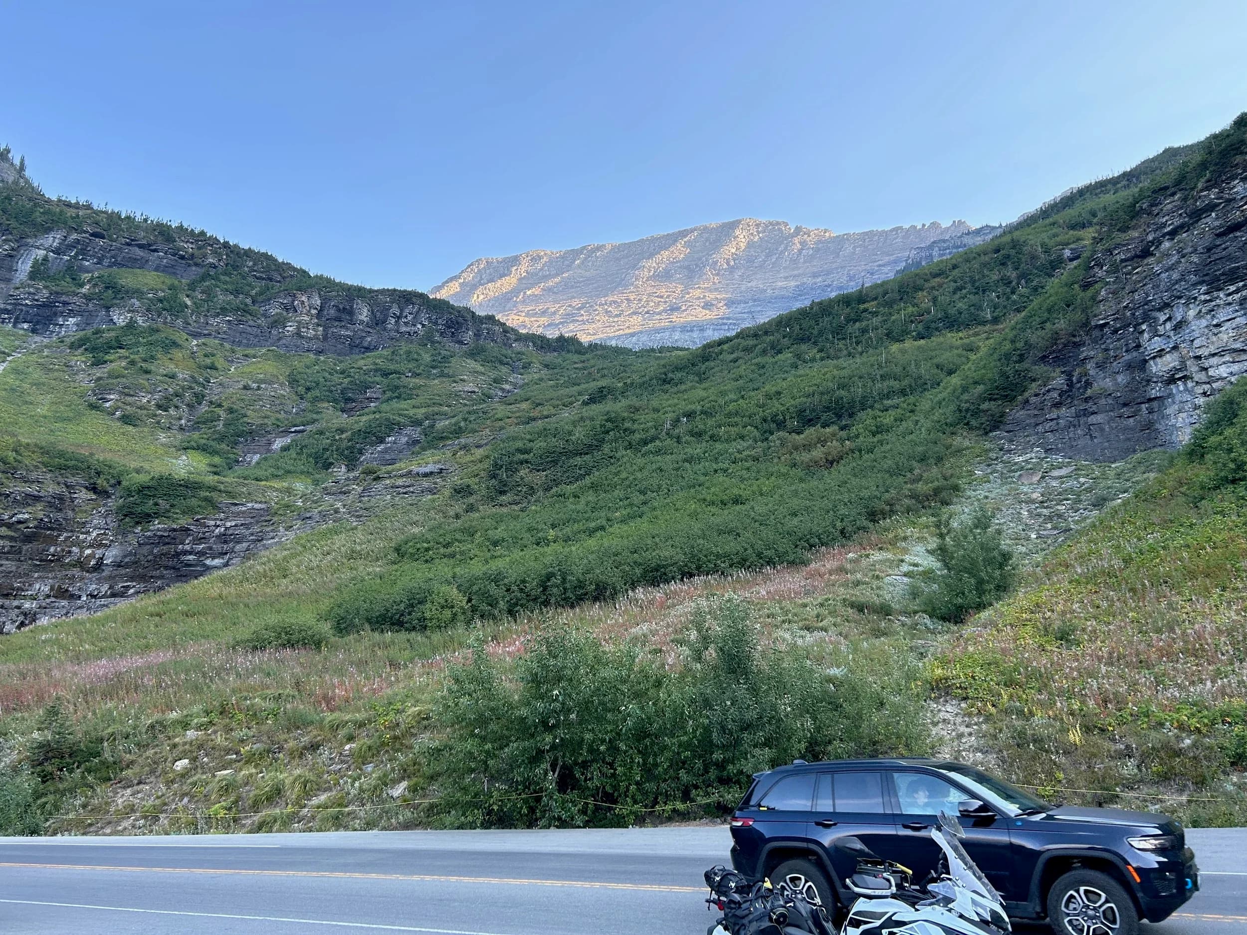 Trip Report: NW National Parks Loop
I left my job recently to take a much needed sabbatical and figure out what I’m doing next. A few weeks after my last day at work I embarked on what was to be a three week tour of NW-ish National Parks from Portland, to include Olympic, North Cascades, Glacier, Yellowstone, Grand Teton, Craters of the Moon, Lassen Volcanic, and Crater Lake.
I ended up missing Grand Tetons due to weather and I had to cut the trip short before I got to Lassen (family medical issue), so Lassen and Crater Lake remain unvisited.
Trip Dates: Sept 3 - Sept 16 (13 days)
Total Travel Miles: 3478 (does not include local miles for store runs, etc.)
Total Gallons of Gas Used: 82
Equipment: 2021 Benelli TRK502X Gaia GPS & Google Maps running on Sonim XP8 rugged Android phoneButler Motorcycle Maps (paper maps of best M/C roads in the country) iPhone 14 (main camera) Akaso Brave 7 helmet-mounted adventure camera Spot X satellite communicator and tracker Wolfman Luggage WP waterproof tank bag and saddle bags (no longer available) Watershed Colorado dry bag duffel (across the pillion seat) Kriega US-5 Drypack (tail bag) Kriega 3L hydration backpack (strapped to duffel, not worn)Marmot Ajax 2 tent Nemo hydrophobic down sleeping bag (non-mummy)Helinox ultralight cot MSR WhisperLite International stove
(Purchased in 1991 for my first moto trip: Detroit, MI to San Diego and back on an XT250)Gossamer Gear Bare Boxer bear-proof food canisters (two - one in each saddle bag)
Day 1 - Olympic National Park Date: Tuesday 9/3/2024
Destination: South Beach Campground, Olympic National Park
Travel Time: 4h 24m
Miles: 213Notes:
Planned to head west to Astoria then north from there, but left later than expected so headed up I-5 to US 12. I’ve driven/ridden that stretch of I-5 hundreds of times (starting in 1993). It’s boring and I hate it.
South Beach CG is first-come-first-served. I didn’t have issue getting a site. There is a long, tight loop of sites along the coastline, but I chose one of the sites further back near the bathrooms due to wind concerns. The bathroom building provided a sort of wind shelter for my site.
I used the heated grips on this leg; it was pretty chilly along the coast in the Olympic Peninsula. I almost didn’t install them, thinking I was being paranoid about the cold. I ended up using them a lot.
Day 2 - Ferry to Seattle / Burien Date: Wednesday 9/4/2024
Destination: Friend’s house in Burien, WA
Travel Time: 7h 30m
Miles: 199
Notes:
Slept well (thanks to Advil PM). I’ve not been sleeping well for more than a year. I’m really hoping to reset my sleep patterns with this trip. A good night’s sleep is one of my great joys and I feel like I’ve been robbed of that pleasure.
Used my Aeropress this morning for the first time ever. I’m hooked.
Headed up along US 101 through Port Angeles and then down to the Southworth ferry terminal near Port Orchard. Ferried across to Fauntleroy, which is just a few miles north my friend’s house in Burien. I’m always surprised at how long it takes to get from the Olympic Peninsula to the east side of Puget Sound (Seattle, etc.). With the ferry crossing (I love ferries) it took seven and a half hours to go 200 miles.
Discovered at my first stop of the day (just up 101 at the Kalaloch Campground, stopped to refill water) that the battery is quite weak and won’t start the bike if you leave the ignition on for even two minutes without the motor running. This would become a theme for the next few days. Fortunately, I have a jumper box and a permanent jump harness wired to the battery so jump starts are a quick operation.
Had a good evening with old friends.
Day 3 - North Cascades via Mountain Loop RoadDate: Thursday 9/5/2024
Destination: Newhalem Campground, North Cascades National Park
Travel Time: 4h 30m
Miles: 146Notes:
Slept well, on the couch. No pills needed.
I realized yesterday that my summer riding gloves (Rev’It Dune) were a size (or two) too small. Rev’It gloves fit really tight and I feel like I can never get it quite right. And yet, I love them. So, I stopped at a Cycle Gear in Bellevue to pick up something summer weight (Dirt 3) that fit better. They’re better, but maybe still one size too small. Such is life.
From Bellevue, I rode north and took the Mountain Loop Hwy then on up north to North Cascades. It was a hot ride. Still summer.
A small section of the Mountain Loop Road is dirt/gravel, which I didn’t realize. No biggie. Was just surprised (clearly I didn’t study my maps closely enough). When riding solo on a bike that weighs over 500 lbs., I tend to avoid planning much off-pavement riding. That’s what my DR-Z is for.
Day 4 - Newport, Washington via Winthrop Date: Friday 9/6/2024
Destination: Golden Spur Motor Inn, Newport, Washington
Travel Time: 8h
Miles: 308
Notes:
Slept just ok, even with Advil PM.
Pretty ride through North Cascades National Park and Colville National Forest. Didn’t do any backroads or hikes. Discovered (new to me) the town of Winthrop. Stopped for coffee at Sheri’s and resupplied on freeze-dried food at Cascades Outdoor Store.
The town of Newport is almost nothing, but, inexplicably, there’s an amazing restaurant (Brownell’s Place). Had dinner and a few ciders. Met and chatted with the owner/chef (she’s great). Listened to some live music. Then back to the motel.
Day 5 - New Battery in Kalispell Date: Saturday 9/7/2024
Destination: West Glacier KOA, West Glacier, MT
Travel Time: 8h 7m
Miles: 293
Notes:
Slept well on motel bed (on sleeping bag, not in the sheets). Another hot one.
Discovered that the water pump seal leaks oil. A quick post in the TRK Facebook group revealed that this is a common problem on this bike, and and easy fix. It’s apparently just a bad o-ring.
Battery has been getting continuously worse, and now requires I jump start the bike about every other start. Google Maps to the rescue: directions to the Batteries Plus in Kalispell, please. They don’t have an Odyssey AGM in the right size; the Duracell will have to do. (It’s been great.)
I set up camp at the West Glacier KOA, which will be my base for a few days. KOAs are their own little world. Very strange. Not really my thing, but the on-site laundry was handy.
After setting up camp I opened a cider and used the iPad to book a vehicle reservation for the next day to ride Going to the Sun Road, which I really wanted to do.
Day 6 - Going to the Sun RoadDate: Sunday 9/8/2024
Destination: Local Ride: West Glacier, Going to the Sun Road, Saint Mary, East Glacier
Travel Time: 5h 35m
Miles: 142Notes:
Quick breakfast and gas up in West Glacier before entering Going to the Sun Road.
Going to the Sun Road was stunning. This was the first point in the trip where I had tingles and was giddy at what I was seeing.
Took a very short hike along Saint Mary Lake. Again, I was beside myself with the beauty.
Lunch at the general store in Kiowa.
The rest of the ride back after East Glacier was meh, but I just kept thinking about how amazing what I’d seen in the morning had been.
Dinner at the KOA. Tacos from a cart (ok / not great, and a very weird guacamole) and a few glasses of wine from another cart. I asked about the guac and it turns out they make it in a food processor. Come on, people.
Day 7 - Ride to BozemanDate: Monday 9/9/2024
Destination: Friend’s house in Bozeman, Montana
Travel Time: ~ 8h (Gaia crashed near the end of the trip, but before getting to Bozeman)
Miles: ~ 400Notes:
Slept poorly again. No pills this time. Took some photos of my soft luggage setup to answer some questions in the TRK502X Facebook group. The saddle bags are from Wolfman Luggage, but I don’t think they make this waterproof line anymore. I use a duffel dry bag from Watershed across the top. A heat shield protects the side bag from exhaust heat.
Hazy, smoky ride most of the way. Very windy in places. This is where I first really started to feel how underpowered the TRK502 is. Really struggled in places.
Developed an engine-speed-sensitive squeak or rattle. Sounds like when a heat shield vibrates in resonance with engine vibration. Discovered that it’s a missing crash bar mounting bolt allowing the crash bar to rub against the frame.
Also noticed that there’s a resonant oscillation at speed that feels like the chain going bad (like it’s stretching unevenly).
First of several nights at a friend’s house in Bozeman (which, it turns out, is a pretty cool town). And there’s a hot tub…
Day 8 - Bike Maintenance & Hyalite ReservoirDate: Tuesday 9/10/2024
Destination: Local Ride: Hyalite Reservoir
Travel Time: not recorded
Miles: not recordedNotes:
Woke up to a smoky sunrise. I had the best night’s sleep I’ve had in years. This is was the whole point of this trip: to untangle my burnout and reclaim sleep as one of my joys. I wrote about it in my journal when I woke up. I hope this wasn’t a fluke.
Planned to replace the bolt that rattled loose from the crash bar, but instead discovered that it had actually severed off at the mount point. No fixing that on the road. Adjusted chain and moved on.
Lunch at Mountains Walking Brewery in Bozeman.
Rode up to Hyalite Reservoir. Pretty ride. Smoky still.
Soaked in hot tub after dinner.
Day 9 - North Yellowstone LoopDate: Wednesday 9/11/2024
Destination: Northern loop through Yellowstone National Park
Travel Time: 9h 36m
Miles: 272Notes:
Did a day trip from Bozeman down through the northern loop in Yellowstone, entering at Mammoth and taking the scenic route through Paradise Valley.
Saw elk, coyotes (I think), buffalo, and pronghorn.
Pretty ride, but cold in places. Used heated grips again.
Rode the loop through Mammoth Hot Springs (see video) at the end.
Coffee at Tumbleweed Bookstore & Cafe in Gardiner. I kind of dig Gardiner. Good vibe.
Had dinner at Mountains Walking Brewing. Rain and wind started. Lights flickered. Waited for rain to stop before riding back to the house.
Power out at the house due to high winds. This does not bode well for tomorrow.
Day 10 - Winter Weather in the ParksDate: Thursday 9/12/2024
Destination: Grand Teton National Park via West Yellowstone Pocatello, Idaho
Travel Time: 5h 40m
Miles: 201Notes:
Today was supposed to be a gorgeous ride through Yellowstone into Grand Teton National Park, and camping at Signal Mountain CG in the park. The weather had other ideas. It was pouring rain (and cold) all the way to West Yellowstone from Bozeman. By the time I got to West Yellowstone I was getting severe winter weather warnings on my phone calling for up to 3 (three!!) inches of snow accumulating in the high passes in the park. It’s bad enough in a car, but that’s a disaster waiting to happen on a motorcycle.
I parked my butt at Mountain Mama’s Cafe in West Yellowstone to warm up / dry off and decide what to do. I almost had myself convinced to push through when I realized that, even if I made it to the campground ok, I’d be setting up camp in the rain and I’d likely be miserable all night. Grand Teton would have to wait.
From West Yellowstone it’s easy to bail west into Idaho and get away from the park weather and elevations. So that’s what I did. It was not a pleasant ride, though. I was in torrential downpours all the way to Idaho Falls.
Arriving in Idaho Falls, I was exhausted and sure I could just find a room for the night. I dropped the bike at a roundabout (short-legged it coming to a stop; I knew it was going so I just rolled away). Guy behind me helped me pick it up. Then, there were no rooms because it was move in week for the two universities there (U of I, ISU). This would become a recurring theme.
I rode further to Blackfoot. Still no rooms.
I called ahead to Pocatello and got a room at a Red Lion there. I was never so happy to be off the bike.
No pictures this day. I couldn’t even get the action camera to turn on.
Day 11 - Craters of the Moon and EBR-1Date: Friday 9/13/2024
Destination: Craters of the Moon National Monument
Travel Time: 4h 20m
Miles: 124
Notes:
I wasn’t sure what my destination would be today but my plan was to do a little nuclear tourism, see Craters of the Moon, and then go somewhere from there. My schedule and day-plan was thrown off by missing Grand Teton National Park and spending a night in Pocatello, which was not on the itinerary at all.
Stopped in Atomic City. Not sure why; I was under the impression that Atomic City was the first city lit by nuclear engergy, but it was practically a ghost town. There are a few houses there, but as far as I could tell all of the business were shuttered. Except, maybe, for the race track; that looked like it might still get used.
Arco, it turns out, is the city celebrated as the first in the world to be lit by nuclear energy. Nothing special about the town, but they do a nice job of making City Hall photo-worthy.
Between Atomic City and Arco is EBR-1 (Experimental Breeder Reactor I) which was the world’s first breeder reactor. The EBR-1 exhibit was closed for the season, but in the lot next to it were some really interesting experimental nuclear heat-transfer jet engines that never made it out of the experimental phase (probably a good thing).
Craters of the Moon is pretty small. If you don’t do any of the walks, it’s literally just a 30 minute road loop. Still, it was an unexpected surprise and delight. I had no idea what to expect but I was positively chuffed at the experience. I noticed that the campground had open sites so I inquired at the entry booth. As luck would have it, the whole campground is first come / first serve. I decided to set up for the night. It’s good to be done early and have some time to read and not stress about making distance.
Day 12 - New Chain in Twin FallsDate: Saturday 9/14/2024
Destination: Battle Mountain, Nevada
Travel Time: 8h 52m
Miles: 335
Notes:
Beautiful morning in Craters of the Moon. While I was breaking camp a parade of classic cars came into the park to drive the loop. I got a picture of one Pontiac down the road in Carey at a gas station.
Carey ended up being an unplanned fork in the road for me. I discovered this morning that my chain was indeed stretching unevenly, and the oscillation I was feeling and hearing was the chain hum changing from a “loose” hum to a “tight” hum rapidly as the tight spot moved around the sprockets. I was supposed to continue west to Mountain Home and then south from there into Nevada. A very scenic route, according to my Butler map. But, between camp and the gas station I got pretty paranoid about the chain snapping at high speed, which, worst case, could lead to a fatal crash.
So I called ahead to a few motorcycle dealers in Mountain Home (on my planned route) to see if they could take me in and replace the chain. No dice. This is the downside of having an obscure motorcycle from an obscure marque - no one wants to work on it. Making matters worse this is an Italian-designed bike built in China, a fact which causes many people to lose the ability to think clearly. “It’s Chinese junk!” Not so. Next.
With Mountain Home out, I tried Twin Falls. My first call was to Adventure Motorsports, and the service manager there took me in with no hesitation. “How soon can you be here?” I didn’t get his name, but my hat’s off to him and his one tech working furiously on a Saturday to beat the 3pm closing time. He said during high season, they get about 15-20 out of town travelers per week who need something done, and they take them all in. I love to hear stuff like this. This shop is in it for the community. They have a nice showroom, too.
With a quality new chain installed, I got a burrito and a MexiCoke at a Mexican place and went on my way. I made it to Battle Mountain, NV, where I decide to get a room. Tomorrow I rejoin my planned scenic route. Day 13 - Desert Mountains in NV, CADate: Sunday 9/15/2024
Destination: Grizzly Campground, Lake Davis (near Portola, CA)
Travel Time: 7h
Miles: 307
Notes:
I love the northern Nevada landscape, and today’s ride didn’t disappoint. US Highway 50 is apparently known as “The Loneliest Highway” but everyone knows about it, so it’s not very lonely. However, after leaving Austin, NV headed west you can take Nevada Highway 722, which dips to the south and follows the old US 50 route. It was completely empty and the twisties through the passes were fun. Highly recommended.
Stopped in Fallon for gas and to find a Micro SD card for the action camera. Walmart to the rescue.
After Reno, I crossed into California and, I swear, it looks different. Norther California desert mountains are so beautiful.
Camped at a nearly empty campground on Lake Davis (very end of the season). The host warned me rain was coming tomorrow.
Day 14 - Unplanned Return HomeDate: Monday 9/16/2024
Destination: Summit Lake Campground, Lassen Volcanic National Park Portland, Oregon (Home)
Travel Time: 10h 32m
Miles: 538Notes:
Last week, my mom went into the hospital for a fairly routine procedure. My brother went to Michigan to help out, as needed, and he went back home to Arizona after she returned home and everything seemed settled.
This morning, while having coffee, I got a call that she’d gone back into the hospital with something that may or may not have been related to the procedure. It seemed like maybe things were ok, but maybe not.
I decided the best thing to do was head home so that I was near an airport if I needed to fly out to Michigan to help out.
I packed up camp and headed up US 395 toward home, via Klamath Falls. It was a pretty ride, but, once again, I found myself in rain most of the way to Klamath Falls.
I was pretty beat by the time I got to Klamath Falls and figured I’d just find a hotel room, get a hot shower, and finish the ride tomorrow.
But, once again, it was move-in week for the local university. Holiday Inn Express had a single room for $395. No thanks. Onward.
I never hit rain again after Klamath Falls, and after turning west onto Oregon Hwy 58 and starting to lose elevation into the Willamette Valley, the temperature starting rising, which was welcome.
Once I reached Eugene, there was no point in not just going all the way home, so that’s what I did.
I got two pictures: one at camp before the call, and one at my last gas stop, an hour and twenty minutes from home, with the moon rising.
A nice side effect of my early return home is that I was home for my birthday (tomorrow), so I had dinner with my kids and my wife, which was lovely.
I did end up flying to Michigan the next day, and was there for a bit. The best part? I got to make some meals for my mom and step dad. Everything seems ok with my mom for now.
Grand Teton, Lassen, and Crater Lake will be there, and now I have an excuse for another trip in the future.