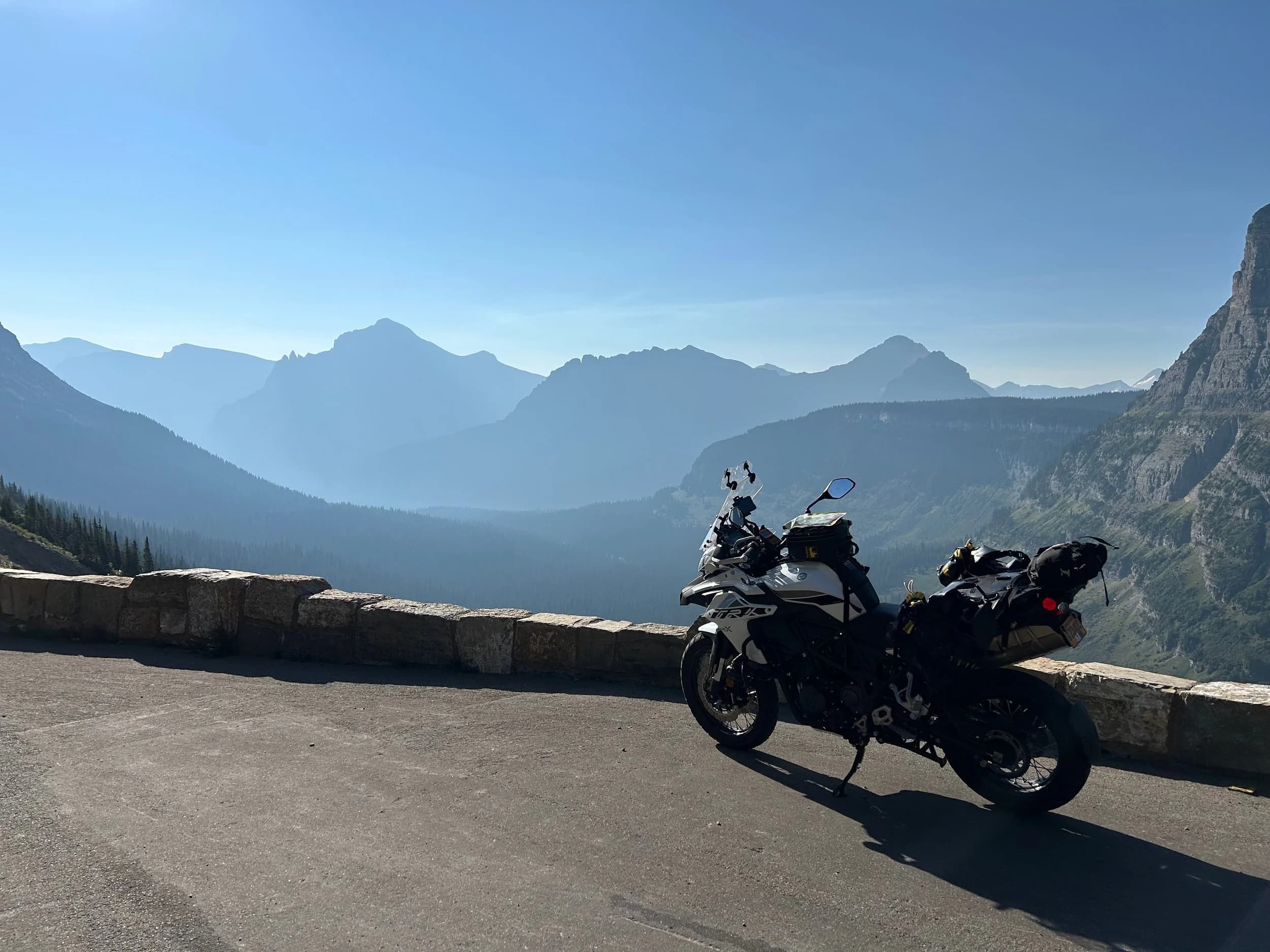 Trip Report: NW National Parks Loop
I left my job recently to take a much needed sabbatical and figure out what I’m doing next. A few weeks after my last day at work I embarked on what was to be a three week tour of NW-ish National Parks from Portland, to include Olympic, North Cascades, Glacier, Yellowstone, Grand Teton, Craters of the Moon, Lassen Volcanic, and Crater Lake.
I ended up missing Grand Tetons due to weather and I had to cut the trip short before I got to Lassen (family medical issue), so Lassen and Crater Lake remain unvisited.
Trip Dates: Sept 3 - Sept 16 (13 days)
Total Travel Miles: 3478 (does not include local miles for store runs, etc.)
Total Gallons of Gas Used: 82
Equipment: 2021 Benelli TRK502X Gaia GPS & Google Maps running on Sonim XP8 rugged Android phoneButler Motorcycle Maps (paper maps of best M/C roads in the country) iPhone 14 (main camera) Akaso Brave 7 helmet-mounted adventure camera Spot X satellite communicator and tracker Wolfman Luggage WP waterproof tank bag and saddle bags (no longer available) Watershed Colorado dry bag duffel (across the pillion seat) Kriega US-5 Drypack (tail bag) Kriega 3L hydration backpack (strapped to duffel, not worn)Marmot Ajax 2 tent Nemo hydrophobic down sleeping bag (non-mummy)Helinox ultralight cot MSR WhisperLite International stove
(Purchased in 1991 for my first moto trip: Detroit, MI to San Diego and back on an XT250)Gossamer Gear Bare Boxer bear-proof food canisters (two - one in each saddle bag)
Day 1 - Olympic National Park Date: Tuesday 9/3/2024
Destination: South Beach Campground, Olympic National Park
Travel Time: 4h 24m
Miles: 213Notes:
Planned to head west to Astoria then north from there, but left later than expected so headed up I-5 to US 12. I’ve driven/ridden that stretch of I-5 hundreds of times (starting in 1993). It’s boring and I hate it.
South Beach CG is first-come-first-served. I didn’t have issue getting a site. There is a long, tight loop of sites along the coastline, but I chose one of the sites further back near the bathrooms due to wind concerns. The bathroom building provided a sort of wind shelter for my site.
I used the heated grips on this leg; it was pretty chilly along the coast in the Olympic Peninsula. I almost didn’t install them, thinking I was being paranoid about the cold. I ended up using them a lot.
Day 2 - Ferry to Seattle / Burien Date: Wednesday 9/4/2024
Destination: Friend’s house in Burien, WA
Travel Time: 7h 30m
Miles: 199
Notes:
Slept well (thanks to Advil PM). I’ve not been sleeping well for more than a year. I’m really hoping to reset my sleep patterns with this trip. A good night’s sleep is one of my great joys and I feel like I’ve been robbed of that pleasure.
Used my Aeropress this morning for the first time ever. I’m hooked.
Headed up along US 101 through Port Angeles and then down to the Southworth ferry terminal near Port Orchard. Ferried across to Fauntleroy, which is just a few miles north my friend’s house in Burien. I’m always surprised at how long it takes to get from the Olympic Peninsula to the east side of Puget Sound (Seattle, etc.). With the ferry crossing (I love ferries) it took seven and a half hours to go 200 miles.
Discovered at my first stop of the day (just up 101 at the Kalaloch Campground, stopped to refill water) that the battery is quite weak and won’t start the bike if you leave the ignition on for even two minutes without the motor running. This would become a theme for the next few days. Fortunately, I have a jumper box and a permanent jump harness wired to the battery so jump starts are a quick operation.
Had a good evening with old friends.
Day 3 - North Cascades via Mountain Loop RoadDate: Thursday 9/5/2024
Destination: Newhalem Campground, North Cascades National Park
Travel Time: 4h 30m
Miles: 146Notes:
Slept well, on the couch. No pills needed.
I realized yesterday that my summer riding gloves (Rev’It Dune) were a size (or two) too small. Rev’It gloves fit really tight and I feel like I can never get it quite right. And yet, I love them. So, I stopped at a Cycle Gear in Bellevue to pick up something summer weight (Dirt 3) that fit better. They’re better, but maybe still one size too small. Such is life.
From Bellevue, I rode north and took the Mountain Loop Hwy then on up north to North Cascades. It was a hot ride. Still summer.
A small section of the Mountain Loop Road is dirt/gravel, which I didn’t realize. No biggie. Was just surprised (clearly I didn’t study my maps closely enough). When riding solo on a bike that weighs over 500 lbs., I tend to avoid planning much off-pavement riding. That’s what my DR-Z is for.
Day 4 - Newport, Washington via Winthrop Date: Friday 9/6/2024
Destination: Golden Spur Motor Inn, Newport, Washington
Travel Time: 8h
Miles: 308
Notes:
Slept just ok, even with Advil PM.
Pretty ride through North Cascades National Park and Colville National Forest. Didn’t do any backroads or hikes. Discovered (new to me) the town of Winthrop. Stopped for coffee at Sheri’s and resupplied on freeze-dried food at Cascades Outdoor Store.
The town of Newport is almost nothing, but, inexplicably, there’s an amazing restaurant (Brownell’s Place). Had dinner and a few ciders. Met and chatted with the owner/chef (she’s great). Listened to some live music. Then back to the motel.
Day 5 - New Battery in Kalispell Date: Saturday 9/7/2024
Destination: West Glacier KOA, West Glacier, MT
Travel Time: 8h 7m
Miles: 293
Notes:
Slept well on motel bed (on sleeping bag, not in the sheets). Another hot one.
Discovered that the water pump seal leaks oil. A quick post in the TRK Facebook group revealed that this is a common problem on this bike, and and easy fix. It’s apparently just a bad o-ring.
Battery has been getting continuously worse, and now requires I jump start the bike about every other start. Google Maps to the rescue: directions to the Batteries Plus in Kalispell, please. They don’t have an Odyssey AGM in the right size; the Duracell will have to do. (It’s been great.)
I set up camp at the West Glacier KOA, which will be my base for a few days. KOAs are their own little world. Very strange. Not really my thing, but the on-site laundry was handy.
After setting up camp I opened a cider and used the iPad to book a vehicle reservation for the next day to ride Going to the Sun Road, which I really wanted to do.
Day 6 - Going to the Sun RoadDate: Sunday 9/8/2024
Destination: Local Ride: West Glacier, Going to the Sun Road, Saint Mary, East Glacier
Travel Time: 5h 35m
Miles: 142Notes:
Quick breakfast and gas up in West Glacier before entering Going to the Sun Road.
Going to the Sun Road was stunning. This was the first point in the trip where I had tingles and was giddy at what I was seeing.
Took a very short hike along Saint Mary Lake. Again, I was beside myself with the beauty.
Lunch at the general store in Kiowa.
The rest of the ride back after East Glacier was meh, but I just kept thinking about how amazing what I’d seen in the morning had been.
Dinner at the KOA. Tacos from a cart (ok / not great, and a very weird guacamole) and a few glasses of wine from another cart. I asked about the guac and it turns out they make it in a food processor. Come on, people.
Day 7 - Ride to BozemanDate: Monday 9/9/2024
Destination: Friend’s house in Bozeman, Montana
Travel Time: ~ 8h (Gaia crashed near the end of the trip, but before getting to Bozeman)
Miles: ~ 400Notes:
Slept poorly again. No pills this time. Took some photos of my soft luggage setup to answer some questions in the TRK502X Facebook group. The saddle bags are from Wolfman Luggage, but I don’t think they make this waterproof line anymore. I use a duffel dry bag from Watershed across the top. A heat shield protects the side bag from exhaust heat.
Hazy, smoky ride most of the way. Very windy in places. This is where I first really started to feel how underpowered the TRK502 is. Really struggled in places.
Developed an engine-speed-sensitive squeak or rattle. Sounds like when a heat shield vibrates in resonance with engine vibration. Discovered that it’s a missing crash bar mounting bolt allowing the crash bar to rub against the frame.
Also noticed that there’s a resonant oscillation at speed that feels like the chain going bad (like it’s stretching unevenly).
First of several nights at a friend’s house in Bozeman (which, it turns out, is a pretty cool town). And there’s a hot tub…
Day 8 - Bike Maintenance & Hyalite ReservoirDate: Tuesday 9/10/2024
Destination: Local Ride: Hyalite Reservoir
Travel Time: not recorded
Miles: not recordedNotes:
Woke up to a smoky sunrise. I had the best night’s sleep I’ve had in years. This is was the whole point of this trip: to untangle my burnout and reclaim sleep as one of my joys. I wrote about it in my journal when I woke up. I hope this wasn’t a fluke.
Planned to replace the bolt that rattled loose from the crash bar, but instead discovered that it had actually severed off at the mount point. No fixing that on the road. Adjusted chain and moved on.
Lunch at Mountains Walking Brewery in Bozeman.
Rode up to Hyalite Reservoir. Pretty ride. Smoky still.
Soaked in hot tub after dinner.
Day 9 - North Yellowstone LoopDate: Wednesday 9/11/2024
Destination: Northern loop through Yellowstone National Park
Travel Time: 9h 36m
Miles: 272Notes:
Did a day trip from Bozeman down through the northern loop in Yellowstone, entering at Mammoth and taking the scenic route through Paradise Valley.
Saw elk, coyotes (I think), buffalo, and pronghorn.
Pretty ride, but cold in places. Used heated grips again.
Rode the loop through Mammoth Hot Springs (see video) at the end.
Coffee at Tumbleweed Bookstore & Cafe in Gardiner. I kind of dig Gardiner. Good vibe.
Had dinner at Mountains Walking Brewing. Rain and wind started. Lights flickered. Waited for rain to stop before riding back to the house.
Power out at the house due to high winds. This does not bode well for tomorrow.
Day 10 - Winter Weather in the ParksDate: Thursday 9/12/2024
Destination: Grand Teton National Park via West Yellowstone Pocatello, Idaho
Travel Time: 5h 40m
Miles: 201Notes:
Today was supposed to be a gorgeous ride through Yellowstone into Grand Teton National Park, and camping at Signal Mountain CG in the park. The weather had other ideas. It was pouring rain (and cold) all the way to West Yellowstone from Bozeman. By the time I got to West Yellowstone I was getting severe winter weather warnings on my phone calling for up to 3 (three!!) inches of snow accumulating in the high passes in the park. It’s bad enough in a car, but that’s a disaster waiting to happen on a motorcycle.
I parked my butt at Mountain Mama’s Cafe in West Yellowstone to warm up / dry off and decide what to do. I almost had myself convinced to push through when I realized that, even if I made it to the campground ok, I’d be setting up camp in the rain and I’d likely be miserable all night. Grand Teton would have to wait.
From West Yellowstone it’s easy to bail west into Idaho and get away from the park weather and elevations. So that’s what I did. It was not a pleasant ride, though. I was in torrential downpours all the way to Idaho Falls.
Arriving in Idaho Falls, I was exhausted and sure I could just find a room for the night. I dropped the bike at a roundabout (short-legged it coming to a stop; I knew it was going so I just rolled away). Guy behind me helped me pick it up. Then, there were no rooms because it was move in week for the two universities there (U of I, ISU). This would become a recurring theme.
I rode further to Blackfoot. Still no rooms.
I called ahead to Pocatello and got a room at a Red Lion there. I was never so happy to be off the bike.
No pictures this day. I couldn’t even get the action camera to turn on.
Day 11 - Craters of the Moon and EBR-1Date: Friday 9/13/2024
Destination: Craters of the Moon National Monument
Travel Time: 4h 20m
Miles: 124
Notes:
I wasn’t sure what my destination would be today but my plan was to do a little nuclear tourism, see Craters of the Moon, and then go somewhere from there. My schedule and day-plan was thrown off by missing Grand Teton National Park and spending a night in Pocatello, which was not on the itinerary at all.
Stopped in Atomic City. Not sure why; I was under the impression that Atomic City was the first city lit by nuclear engergy, but it was practically a ghost town. There are a few houses there, but as far as I could tell all of the business were shuttered. Except, maybe, for the race track; that looked like it might still get used.
Arco, it turns out, is the city celebrated as the first in the world to be lit by nuclear energy. Nothing special about the town, but they do a nice job of making City Hall photo-worthy.
Between Atomic City and Arco is EBR-1 (Experimental Breeder Reactor I) which was the world’s first breeder reactor. The EBR-1 exhibit was closed for the season, but in the lot next to it were some really interesting experimental nuclear heat-transfer jet engines that never made it out of the experimental phase (probably a good thing).
Craters of the Moon is pretty small. If you don’t do any of the walks, it’s literally just a 30 minute road loop. Still, it was an unexpected surprise and delight. I had no idea what to expect but I was positively chuffed at the experience. I noticed that the campground had open sites so I inquired at the entry booth. As luck would have it, the whole campground is first come / first serve. I decided to set up for the night. It’s good to be done early and have some time to read and not stress about making distance.
Day 12 - New Chain in Twin FallsDate: Saturday 9/14/2024
Destination: Battle Mountain, Nevada
Travel Time: 8h 52m
Miles: 335
Notes:
Beautiful morning in Craters of the Moon. While I was breaking camp a parade of classic cars came into the park to drive the loop. I got a picture of one Pontiac down the road in Carey at a gas station.
Carey ended up being an unplanned fork in the road for me. I discovered this morning that my chain was indeed stretching unevenly, and the oscillation I was feeling and hearing was the chain hum changing from a “loose” hum to a “tight” hum rapidly as the tight spot moved around the sprockets. I was supposed to continue west to Mountain Home and then south from there into Nevada. A very scenic route, according to my Butler map. But, between camp and the gas station I got pretty paranoid about the chain snapping at high speed, which, worst case, could lead to a fatal crash.
So I called ahead to a few motorcycle dealers in Mountain Home (on my planned route) to see if they could take me in and replace the chain. No dice. This is the downside of having an obscure motorcycle from an obscure marque - no one wants to work on it. Making matters worse this is an Italian-designed bike built in China, a fact which causes many people to lose the ability to think clearly. “It’s Chinese junk!” Not so. Next.
With Mountain Home out, I tried Twin Falls. My first call was to Adventure Motorsports, and the service manager there took me in with no hesitation. “How soon can you be here?” I didn’t get his name, but my hat’s off to him and his one tech working furiously on a Saturday to beat the 3pm closing time. He said during high season, they get about 15-20 out of town travelers per week who need something done, and they take them all in. I love to hear stuff like this. This shop is in it for the community. They have a nice showroom, too.
With a quality new chain installed, I got a burrito and a MexiCoke at a Mexican place and went on my way. I made it to Battle Mountain, NV, where I decide to get a room. Tomorrow I rejoin my planned scenic route. Day 13 - Desert Mountains in NV, CADate: Sunday 9/15/2024
Destination: Grizzly Campground, Lake Davis (near Portola, CA)
Travel Time: 7h
Miles: 307
Notes:
I love the northern Nevada landscape, and today’s ride didn’t disappoint. US Highway 50 is apparently known as “The Loneliest Highway” but everyone knows about it, so it’s not very lonely. However, after leaving Austin, NV headed west you can take Nevada Highway 722, which dips to the south and follows the old US 50 route. It was completely empty and the twisties through the passes were fun. Highly recommended.
Stopped in Fallon for gas and to find a Micro SD card for the action camera. Walmart to the rescue.
After Reno, I crossed into California and, I swear, it looks different. Norther California desert mountains are so beautiful.
Camped at a nearly empty campground on Lake Davis (very end of the season). The host warned me rain was coming tomorrow.
Day 14 - Unplanned Return HomeDate: Monday 9/16/2024
Destination: Summit Lake Campground, Lassen Volcanic National Park Portland, Oregon (Home)
Travel Time: 10h 32m
Miles: 538Notes:
Last week, my mom went into the hospital for a fairly routine procedure. My brother went to Michigan to help out, as needed, and he went back home to Arizona after she returned home and everything seemed settled.
This morning, while having coffee, I got a call that she’d gone back into the hospital with something that may or may not have been related to the procedure. It seemed like maybe things were ok, but maybe not.
I decided the best thing to do was head home so that I was near an airport if I needed to fly out to Michigan to help out.
I packed up camp and headed up US 395 toward home, via Klamath Falls. It was a pretty ride, but, once again, I found myself in rain most of the way to Klamath Falls.
I was pretty beat by the time I got to Klamath Falls and figured I’d just find a hotel room, get a hot shower, and finish the ride tomorrow.
But, once again, it was move-in week for the local university. Holiday Inn Express had a single room for $395. No thanks. Onward.
I never hit rain again after Klamath Falls, and after turning west onto Oregon Hwy 58 and starting to lose elevation into the Willamette Valley, the temperature starting rising, which was welcome.
Once I reached Eugene, there was no point in not just going all the way home, so that’s what I did.
I got two pictures: one at camp before the call, and one at my last gas stop, an hour and twenty minutes from home, with the moon rising.
A nice side effect of my early return home is that I was home for my birthday (tomorrow), so I had dinner with my kids and my wife, which was lovely.
I did end up flying to Michigan the next day, and was there for a bit. The best part? I got to make some meals for my mom and step dad. Everything seems ok with my mom for now.
Grand Teton, Lassen, and Crater Lake will be there, and now I have an excuse for another trip in the future.