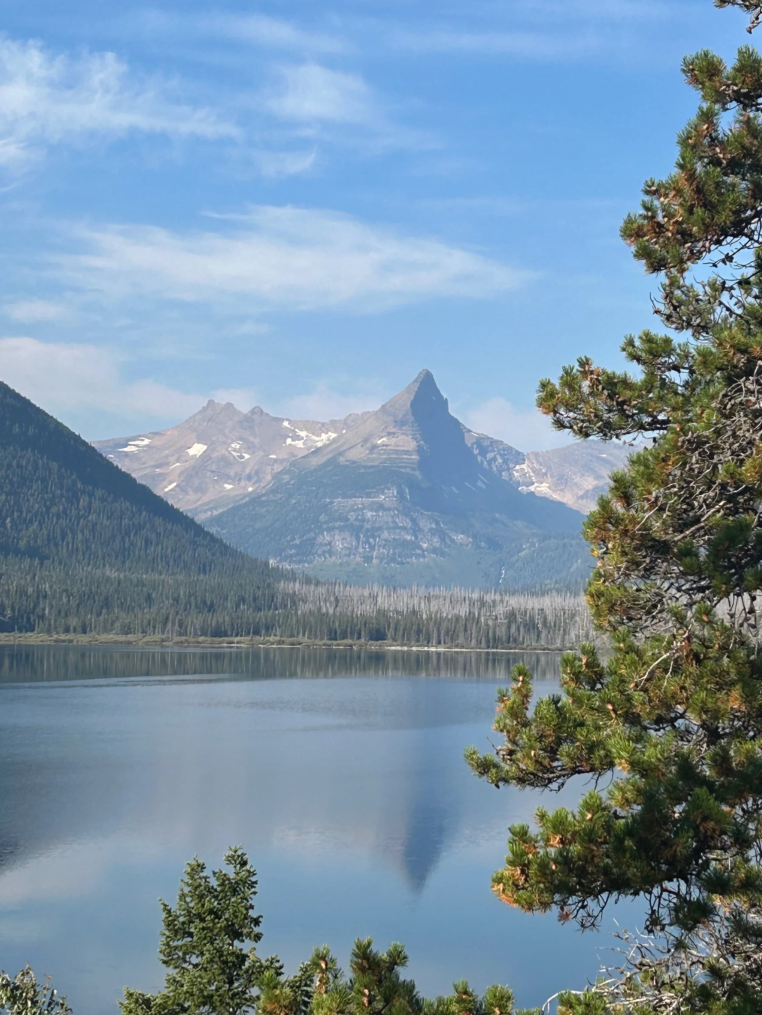 Trip Report: NW National Parks Loop
I left my job recently to take a much needed sabbatical and figure out what I’m doing next. A few weeks after my last day at work I embarked on what was to be a three week tour of NW-ish National Parks from Portland, to include Olympic, North Cascades, Glacier, Yellowstone, Grand Teton, Craters of the Moon, Lassen Volcanic, and Crater Lake.
I ended up missing Grand Tetons due to weather and I had to cut the trip short before I got to Lassen (family medical issue), so Lassen and Crater Lake remain unvisited.
Trip Dates: Sept 3 - Sept 16 (13 days)
Total Travel Miles: 3478 (does not include local miles for store runs, etc.)
Total Gallons of Gas Used: 82
Equipment: 2021 Benelli TRK502X Gaia GPS & Google Maps running on Sonim XP8 rugged Android phoneButler Motorcycle Maps (paper maps of best M/C roads in the country) iPhone 14 (main camera) Akaso Brave 7 helmet-mounted adventure camera Spot X satellite communicator and tracker Wolfman Luggage WP waterproof tank bag and saddle bags (no longer available) Watershed Colorado dry bag duffel (across the pillion seat) Kriega US-5 Drypack (tail bag) Kriega 3L hydration backpack (strapped to duffel, not worn)Marmot Ajax 2 tent Nemo hydrophobic down sleeping bag (non-mummy)Helinox ultralight cot MSR WhisperLite International stove
(Purchased in 1991 for my first moto trip: Detroit, MI to San Diego and back on an XT250)Gossamer Gear Bare Boxer bear-proof food canisters (two - one in each saddle bag)
Day 1 - Olympic National Park Date: Tuesday 9/3/2024
Destination: South Beach Campground, Olympic National Park
Travel Time: 4h 24m
Miles: 213Notes:
Planned to head west to Astoria then north from there, but left later than expected so headed up I-5 to US 12. I’ve driven/ridden that stretch of I-5 hundreds of times (starting in 1993). It’s boring and I hate it.
South Beach CG is first-come-first-served. I didn’t have issue getting a site. There is a long, tight loop of sites along the coastline, but I chose one of the sites further back near the bathrooms due to wind concerns. The bathroom building provided a sort of wind shelter for my site.
I used the heated grips on this leg; it was pretty chilly along the coast in the Olympic Peninsula. I almost didn’t install them, thinking I was being paranoid about the cold. I ended up using them a lot.
Day 2 - Ferry to Seattle / Burien Date: Wednesday 9/4/2024
Destination: Friend’s house in Burien, WA
Travel Time: 7h 30m
Miles: 199
Notes:
Slept well (thanks to Advil PM). I’ve not been sleeping well for more than a year. I’m really hoping to reset my sleep patterns with this trip. A good night’s sleep is one of my great joys and I feel like I’ve been robbed of that pleasure.
Used my Aeropress this morning for the first time ever. I’m hooked.
Headed up along US 101 through Port Angeles and then down to the Southworth ferry terminal near Port Orchard. Ferried across to Fauntleroy, which is just a few miles north my friend’s house in Burien. I’m always surprised at how long it takes to get from the Olympic Peninsula to the east side of Puget Sound (Seattle, etc.). With the ferry crossing (I love ferries) it took seven and a half hours to go 200 miles.
Discovered at my first stop of the day (just up 101 at the Kalaloch Campground, stopped to refill water) that the battery is quite weak and won’t start the bike if you leave the ignition on for even two minutes without the motor running. This would become a theme for the next few days. Fortunately, I have a jumper box and a permanent jump harness wired to the battery so jump starts are a quick operation.
Had a good evening with old friends.
Day 3 - North Cascades via Mountain Loop RoadDate: Thursday 9/5/2024
Destination: Newhalem Campground, North Cascades National Park
Travel Time: 4h 30m
Miles: 146Notes:
Slept well, on the couch. No pills needed.
I realized yesterday that my summer riding gloves (Rev’It Dune) were a size (or two) too small. Rev’It gloves fit really tight and I feel like I can never get it quite right. And yet, I love them. So, I stopped at a Cycle Gear in Bellevue to pick up something summer weight (Dirt 3) that fit better. They’re better, but maybe still one size too small. Such is life.
From Bellevue, I rode north and took the Mountain Loop Hwy then on up north to North Cascades. It was a hot ride. Still summer.
A small section of the Mountain Loop Road is dirt/gravel, which I didn’t realize. No biggie. Was just surprised (clearly I didn’t study my maps closely enough). When riding solo on a bike that weighs over 500 lbs., I tend to avoid planning much off-pavement riding. That’s what my DR-Z is for.
Day 4 - Newport, Washington via Winthrop Date: Friday 9/6/2024
Destination: Golden Spur Motor Inn, Newport, Washington
Travel Time: 8h
Miles: 308
Notes:
Slept just ok, even with Advil PM.
Pretty ride through North Cascades National Park and Colville National Forest. Didn’t do any backroads or hikes. Discovered (new to me) the town of Winthrop. Stopped for coffee at Sheri’s and resupplied on freeze-dried food at Cascades Outdoor Store.
The town of Newport is almost nothing, but, inexplicably, there’s an amazing restaurant (Brownell’s Place). Had dinner and a few ciders. Met and chatted with the owner/chef (she’s great). Listened to some live music. Then back to the motel.
Day 5 - New Battery in Kalispell Date: Saturday 9/7/2024
Destination: West Glacier KOA, West Glacier, MT
Travel Time: 8h 7m
Miles: 293
Notes:
Slept well on motel bed (on sleeping bag, not in the sheets). Another hot one.
Discovered that the water pump seal leaks oil. A quick post in the TRK Facebook group revealed that this is a common problem on this bike, and and easy fix. It’s apparently just a bad o-ring.
Battery has been getting continuously worse, and now requires I jump start the bike about every other start. Google Maps to the rescue: directions to the Batteries Plus in Kalispell, please. They don’t have an Odyssey AGM in the right size; the Duracell will have to do. (It’s been great.)
I set up camp at the West Glacier KOA, which will be my base for a few days. KOAs are their own little world. Very strange. Not really my thing, but the on-site laundry was handy.
After setting up camp I opened a cider and used the iPad to book a vehicle reservation for the next day to ride Going to the Sun Road, which I really wanted to do.
Day 6 - Going to the Sun RoadDate: Sunday 9/8/2024
Destination: Local Ride: West Glacier, Going to the Sun Road, Saint Mary, East Glacier
Travel Time: 5h 35m
Miles: 142Notes:
Quick breakfast and gas up in West Glacier before entering Going to the Sun Road.
Going to the Sun Road was stunning. This was the first point in the trip where I had tingles and was giddy at what I was seeing.
Took a very short hike along Saint Mary Lake. Again, I was beside myself with the beauty.
Lunch at the general store in Kiowa.
The rest of the ride back after East Glacier was meh, but I just kept thinking about how amazing what I’d seen in the morning had been.
Dinner at the KOA. Tacos from a cart (ok / not great, and a very weird guacamole) and a few glasses of wine from another cart. I asked about the guac and it turns out they make it in a food processor. Come on, people.
Day 7 - Ride to BozemanDate: Monday 9/9/2024
Destination: Friend’s house in Bozeman, Montana
Travel Time: ~ 8h (Gaia crashed near the end of the trip, but before getting to Bozeman)
Miles: ~ 400Notes:
Slept poorly again. No pills this time. Took some photos of my soft luggage setup to answer some questions in the TRK502X Facebook group. The saddle bags are from Wolfman Luggage, but I don’t think they make this waterproof line anymore. I use a duffel dry bag from Watershed across the top. A heat shield protects the side bag from exhaust heat.
Hazy, smoky ride most of the way. Very windy in places. This is where I first really started to feel how underpowered the TRK502 is. Really struggled in places.
Developed an engine-speed-sensitive squeak or rattle. Sounds like when a heat shield vibrates in resonance with engine vibration. Discovered that it’s a missing crash bar mounting bolt allowing the crash bar to rub against the frame.
Also noticed that there’s a resonant oscillation at speed that feels like the chain going bad (like it’s stretching unevenly).
First of several nights at a friend’s house in Bozeman (which, it turns out, is a pretty cool town). And there’s a hot tub…
Day 8 - Bike Maintenance & Hyalite ReservoirDate: Tuesday 9/10/2024
Destination: Local Ride: Hyalite Reservoir
Travel Time: not recorded
Miles: not recordedNotes:
Woke up to a smoky sunrise. I had the best night’s sleep I’ve had in years. This is was the whole point of this trip: to untangle my burnout and reclaim sleep as one of my joys. I wrote about it in my journal when I woke up. I hope this wasn’t a fluke.
Planned to replace the bolt that rattled loose from the crash bar, but instead discovered that it had actually severed off at the mount point. No fixing that on the road. Adjusted chain and moved on.
Lunch at Mountains Walking Brewery in Bozeman.
Rode up to Hyalite Reservoir. Pretty ride. Smoky still.
Soaked in hot tub after dinner.
Day 9 - North Yellowstone LoopDate: Wednesday 9/11/2024
Destination: Northern loop through Yellowstone National Park
Travel Time: 9h 36m
Miles: 272Notes:
Did a day trip from Bozeman down through the northern loop in Yellowstone, entering at Mammoth and taking the scenic route through Paradise Valley.
Saw elk, coyotes (I think), buffalo, and pronghorn.
Pretty ride, but cold in places. Used heated grips again.
Rode the loop through Mammoth Hot Springs (see video) at the end.
Coffee at Tumbleweed Bookstore & Cafe in Gardiner. I kind of dig Gardiner. Good vibe.
Had dinner at Mountains Walking Brewing. Rain and wind started. Lights flickered. Waited for rain to stop before riding back to the house.
Power out at the house due to high winds. This does not bode well for tomorrow.
Day 10 - Winter Weather in the ParksDate: Thursday 9/12/2024
Destination: Grand Teton National Park via West Yellowstone Pocatello, Idaho
Travel Time: 5h 40m
Miles: 201Notes:
Today was supposed to be a gorgeous ride through Yellowstone into Grand Teton National Park, and camping at Signal Mountain CG in the park. The weather had other ideas. It was pouring rain (and cold) all the way to West Yellowstone from Bozeman. By the time I got to West Yellowstone I was getting severe winter weather warnings on my phone calling for up to 3 (three!!) inches of snow accumulating in the high passes in the park. It’s bad enough in a car, but that’s a disaster waiting to happen on a motorcycle.
I parked my butt at Mountain Mama’s Cafe in West Yellowstone to warm up / dry off and decide what to do. I almost had myself convinced to push through when I realized that, even if I made it to the campground ok, I’d be setting up camp in the rain and I’d likely be miserable all night. Grand Teton would have to wait.
From West Yellowstone it’s easy to bail west into Idaho and get away from the park weather and elevations. So that’s what I did. It was not a pleasant ride, though. I was in torrential downpours all the way to Idaho Falls.
Arriving in Idaho Falls, I was exhausted and sure I could just find a room for the night. I dropped the bike at a roundabout (short-legged it coming to a stop; I knew it was going so I just rolled away). Guy behind me helped me pick it up. Then, there were no rooms because it was move in week for the two universities there (U of I, ISU). This would become a recurring theme.
I rode further to Blackfoot. Still no rooms.
I called ahead to Pocatello and got a room at a Red Lion there. I was never so happy to be off the bike.
No pictures this day. I couldn’t even get the action camera to turn on.
Day 11 - Craters of the Moon and EBR-1Date: Friday 9/13/2024
Destination: Craters of the Moon National Monument
Travel Time: 4h 20m
Miles: 124
Notes:
I wasn’t sure what my destination would be today but my plan was to do a little nuclear tourism, see Craters of the Moon, and then go somewhere from there. My schedule and day-plan was thrown off by missing Grand Teton National Park and spending a night in Pocatello, which was not on the itinerary at all.
Stopped in Atomic City. Not sure why; I was under the impression that Atomic City was the first city lit by nuclear engergy, but it was practically a ghost town. There are a few houses there, but as far as I could tell all of the business were shuttered. Except, maybe, for the race track; that looked like it might still get used.
Arco, it turns out, is the city celebrated as the first in the world to be lit by nuclear energy. Nothing special about the town, but they do a nice job of making City Hall photo-worthy.
Between Atomic City and Arco is EBR-1 (Experimental Breeder Reactor I) which was the world’s first breeder reactor. The EBR-1 exhibit was closed for the season, but in the lot next to it were some really interesting experimental nuclear heat-transfer jet engines that never made it out of the experimental phase (probably a good thing).
Craters of the Moon is pretty small. If you don’t do any of the walks, it’s literally just a 30 minute road loop. Still, it was an unexpected surprise and delight. I had no idea what to expect but I was positively chuffed at the experience. I noticed that the campground had open sites so I inquired at the entry booth. As luck would have it, the whole campground is first come / first serve. I decided to set up for the night. It’s good to be done early and have some time to read and not stress about making distance.
Day 12 - New Chain in Twin FallsDate: Saturday 9/14/2024
Destination: Battle Mountain, Nevada
Travel Time: 8h 52m
Miles: 335
Notes:
Beautiful morning in Craters of the Moon. While I was breaking camp a parade of classic cars came into the park to drive the loop. I got a picture of one Pontiac down the road in Carey at a gas station.
Carey ended up being an unplanned fork in the road for me. I discovered this morning that my chain was indeed stretching unevenly, and the oscillation I was feeling and hearing was the chain hum changing from a “loose” hum to a “tight” hum rapidly as the tight spot moved around the sprockets. I was supposed to continue west to Mountain Home and then south from there into Nevada. A very scenic route, according to my Butler map. But, between camp and the gas station I got pretty paranoid about the chain snapping at high speed, which, worst case, could lead to a fatal crash.
So I called ahead to a few motorcycle dealers in Mountain Home (on my planned route) to see if they could take me in and replace the chain. No dice. This is the downside of having an obscure motorcycle from an obscure marque - no one wants to work on it. Making matters worse this is an Italian-designed bike built in China, a fact which causes many people to lose the ability to think clearly. “It’s Chinese junk!” Not so. Next.
With Mountain Home out, I tried Twin Falls. My first call was to Adventure Motorsports, and the service manager there took me in with no hesitation. “How soon can you be here?” I didn’t get his name, but my hat’s off to him and his one tech working furiously on a Saturday to beat the 3pm closing time. He said during high season, they get about 15-20 out of town travelers per week who need something done, and they take them all in. I love to hear stuff like this. This shop is in it for the community. They have a nice showroom, too.
With a quality new chain installed, I got a burrito and a MexiCoke at a Mexican place and went on my way. I made it to Battle Mountain, NV, where I decide to get a room. Tomorrow I rejoin my planned scenic route. Day 13 - Desert Mountains in NV, CADate: Sunday 9/15/2024
Destination: Grizzly Campground, Lake Davis (near Portola, CA)
Travel Time: 7h
Miles: 307
Notes:
I love the northern Nevada landscape, and today’s ride didn’t disappoint. US Highway 50 is apparently known as “The Loneliest Highway” but everyone knows about it, so it’s not very lonely. However, after leaving Austin, NV headed west you can take Nevada Highway 722, which dips to the south and follows the old US 50 route. It was completely empty and the twisties through the passes were fun. Highly recommended.
Stopped in Fallon for gas and to find a Micro SD card for the action camera. Walmart to the rescue.
After Reno, I crossed into California and, I swear, it looks different. Norther California desert mountains are so beautiful.
Camped at a nearly empty campground on Lake Davis (very end of the season). The host warned me rain was coming tomorrow.
Day 14 - Unplanned Return HomeDate: Monday 9/16/2024
Destination: Summit Lake Campground, Lassen Volcanic National Park Portland, Oregon (Home)
Travel Time: 10h 32m
Miles: 538Notes:
Last week, my mom went into the hospital for a fairly routine procedure. My brother went to Michigan to help out, as needed, and he went back home to Arizona after she returned home and everything seemed settled.
This morning, while having coffee, I got a call that she’d gone back into the hospital with something that may or may not have been related to the procedure. It seemed like maybe things were ok, but maybe not.
I decided the best thing to do was head home so that I was near an airport if I needed to fly out to Michigan to help out.
I packed up camp and headed up US 395 toward home, via Klamath Falls. It was a pretty ride, but, once again, I found myself in rain most of the way to Klamath Falls.
I was pretty beat by the time I got to Klamath Falls and figured I’d just find a hotel room, get a hot shower, and finish the ride tomorrow.
But, once again, it was move-in week for the local university. Holiday Inn Express had a single room for $395. No thanks. Onward.
I never hit rain again after Klamath Falls, and after turning west onto Oregon Hwy 58 and starting to lose elevation into the Willamette Valley, the temperature starting rising, which was welcome.
Once I reached Eugene, there was no point in not just going all the way home, so that’s what I did.
I got two pictures: one at camp before the call, and one at my last gas stop, an hour and twenty minutes from home, with the moon rising.
A nice side effect of my early return home is that I was home for my birthday (tomorrow), so I had dinner with my kids and my wife, which was lovely.
I did end up flying to Michigan the next day, and was there for a bit. The best part? I got to make some meals for my mom and step dad. Everything seems ok with my mom for now.
Grand Teton, Lassen, and Crater Lake will be there, and now I have an excuse for another trip in the future.