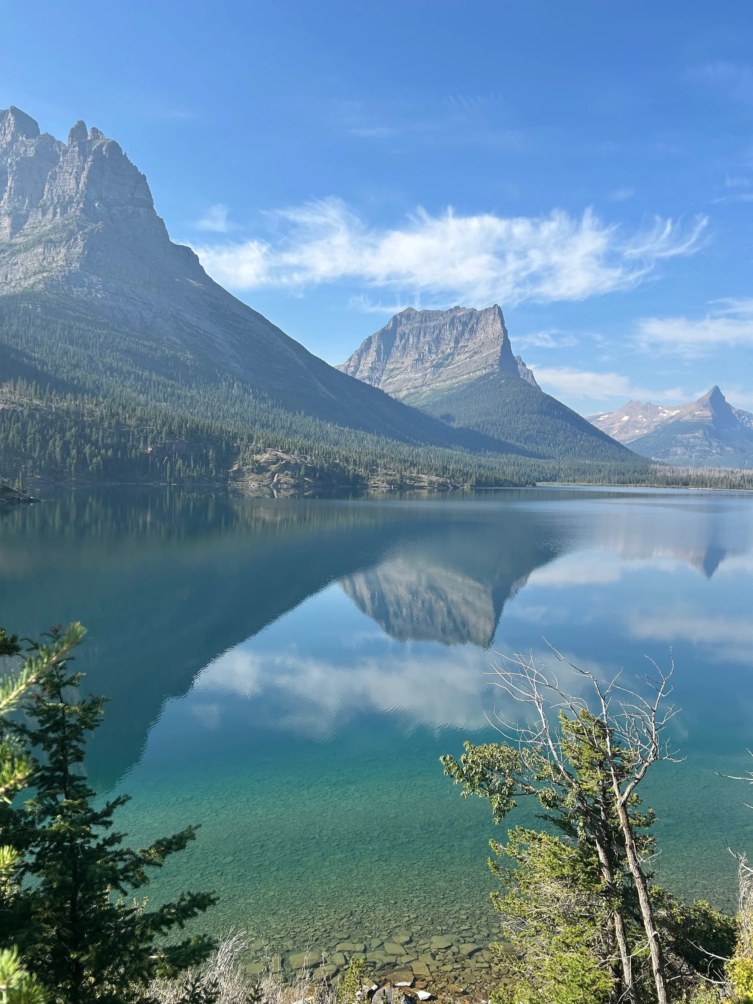 Trip Report: NW National Parks Loop
I left my job recently to take a much needed sabbatical and figure out what I’m doing next. A few weeks after my last day at work I embarked on what was to be a three week tour of NW-ish National Parks from Portland, to include Olympic, North Cascades, Glacier, Yellowstone, Grand Teton, Craters of the Moon, Lassen Volcanic, and Crater Lake.
I ended up missing Grand Tetons due to weather and I had to cut the trip short before I got to Lassen (family medical issue), so Lassen and Crater Lake remain unvisited.
Trip Dates: Sept 3 - Sept 16 (13 days)
Total Travel Miles: 3478 (does not include local miles for store runs, etc.)
Total Gallons of Gas Used: 82
Equipment: 2021 Benelli TRK502X Gaia GPS & Google Maps running on Sonim XP8 rugged Android phoneButler Motorcycle Maps (paper maps of best M/C roads in the country) iPhone 14 (main camera) Akaso Brave 7 helmet-mounted adventure camera Spot X satellite communicator and tracker Wolfman Luggage WP waterproof tank bag and saddle bags (no longer available) Watershed Colorado dry bag duffel (across the pillion seat) Kriega US-5 Drypack (tail bag) Kriega 3L hydration backpack (strapped to duffel, not worn)Marmot Ajax 2 tent Nemo hydrophobic down sleeping bag (non-mummy)Helinox ultralight cot MSR WhisperLite International stove
(Purchased in 1991 for my first moto trip: Detroit, MI to San Diego and back on an XT250)Gossamer Gear Bare Boxer bear-proof food canisters (two - one in each saddle bag)
Day 1 - Olympic National Park Date: Tuesday 9/3/2024
Destination: South Beach Campground, Olympic National Park
Travel Time: 4h 24m
Miles: 213Notes:
Planned to head west to Astoria then north from there, but left later than expected so headed up I-5 to US 12. I’ve driven/ridden that stretch of I-5 hundreds of times (starting in 1993). It’s boring and I hate it.
South Beach CG is first-come-first-served. I didn’t have issue getting a site. There is a long, tight loop of sites along the coastline, but I chose one of the sites further back near the bathrooms due to wind concerns. The bathroom building provided a sort of wind shelter for my site.
I used the heated grips on this leg; it was pretty chilly along the coast in the Olympic Peninsula. I almost didn’t install them, thinking I was being paranoid about the cold. I ended up using them a lot.
Day 2 - Ferry to Seattle / Burien Date: Wednesday 9/4/2024
Destination: Friend’s house in Burien, WA
Travel Time: 7h 30m
Miles: 199
Notes:
Slept well (thanks to Advil PM). I’ve not been sleeping well for more than a year. I’m really hoping to reset my sleep patterns with this trip. A good night’s sleep is one of my great joys and I feel like I’ve been robbed of that pleasure.
Used my Aeropress this morning for the first time ever. I’m hooked.
Headed up along US 101 through Port Angeles and then down to the Southworth ferry terminal near Port Orchard. Ferried across to Fauntleroy, which is just a few miles north my friend’s house in Burien. I’m always surprised at how long it takes to get from the Olympic Peninsula to the east side of Puget Sound (Seattle, etc.). With the ferry crossing (I love ferries) it took seven and a half hours to go 200 miles.
Discovered at my first stop of the day (just up 101 at the Kalaloch Campground, stopped to refill water) that the battery is quite weak and won’t start the bike if you leave the ignition on for even two minutes without the motor running. This would become a theme for the next few days. Fortunately, I have a jumper box and a permanent jump harness wired to the battery so jump starts are a quick operation.
Had a good evening with old friends.
Day 3 - North Cascades via Mountain Loop RoadDate: Thursday 9/5/2024
Destination: Newhalem Campground, North Cascades National Park
Travel Time: 4h 30m
Miles: 146Notes:
Slept well, on the couch. No pills needed.
I realized yesterday that my summer riding gloves (Rev’It Dune) were a size (or two) too small. Rev’It gloves fit really tight and I feel like I can never get it quite right. And yet, I love them. So, I stopped at a Cycle Gear in Bellevue to pick up something summer weight (Dirt 3) that fit better. They’re better, but maybe still one size too small. Such is life.
From Bellevue, I rode north and took the Mountain Loop Hwy then on up north to North Cascades. It was a hot ride. Still summer.
A small section of the Mountain Loop Road is dirt/gravel, which I didn’t realize. No biggie. Was just surprised (clearly I didn’t study my maps closely enough). When riding solo on a bike that weighs over 500 lbs., I tend to avoid planning much off-pavement riding. That’s what my DR-Z is for.
Day 4 - Newport, Washington via Winthrop Date: Friday 9/6/2024
Destination: Golden Spur Motor Inn, Newport, Washington
Travel Time: 8h
Miles: 308
Notes:
Slept just ok, even with Advil PM.
Pretty ride through North Cascades National Park and Colville National Forest. Didn’t do any backroads or hikes. Discovered (new to me) the town of Winthrop. Stopped for coffee at Sheri’s and resupplied on freeze-dried food at Cascades Outdoor Store.
The town of Newport is almost nothing, but, inexplicably, there’s an amazing restaurant (Brownell’s Place). Had dinner and a few ciders. Met and chatted with the owner/chef (she’s great). Listened to some live music. Then back to the motel.
Day 5 - New Battery in Kalispell Date: Saturday 9/7/2024
Destination: West Glacier KOA, West Glacier, MT
Travel Time: 8h 7m
Miles: 293
Notes:
Slept well on motel bed (on sleeping bag, not in the sheets). Another hot one.
Discovered that the water pump seal leaks oil. A quick post in the TRK Facebook group revealed that this is a common problem on this bike, and and easy fix. It’s apparently just a bad o-ring.
Battery has been getting continuously worse, and now requires I jump start the bike about every other start. Google Maps to the rescue: directions to the Batteries Plus in Kalispell, please. They don’t have an Odyssey AGM in the right size; the Duracell will have to do. (It’s been great.)
I set up camp at the West Glacier KOA, which will be my base for a few days. KOAs are their own little world. Very strange. Not really my thing, but the on-site laundry was handy.
After setting up camp I opened a cider and used the iPad to book a vehicle reservation for the next day to ride Going to the Sun Road, which I really wanted to do.
Day 6 - Going to the Sun RoadDate: Sunday 9/8/2024
Destination: Local Ride: West Glacier, Going to the Sun Road, Saint Mary, East Glacier
Travel Time: 5h 35m
Miles: 142Notes:
Quick breakfast and gas up in West Glacier before entering Going to the Sun Road.
Going to the Sun Road was stunning. This was the first point in the trip where I had tingles and was giddy at what I was seeing.
Took a very short hike along Saint Mary Lake. Again, I was beside myself with the beauty.
Lunch at the general store in Kiowa.
The rest of the ride back after East Glacier was meh, but I just kept thinking about how amazing what I’d seen in the morning had been.
Dinner at the KOA. Tacos from a cart (ok / not great, and a very weird guacamole) and a few glasses of wine from another cart. I asked about the guac and it turns out they make it in a food processor. Come on, people.
Day 7 - Ride to BozemanDate: Monday 9/9/2024
Destination: Friend’s house in Bozeman, Montana
Travel Time: ~ 8h (Gaia crashed near the end of the trip, but before getting to Bozeman)
Miles: ~ 400Notes:
Slept poorly again. No pills this time. Took some photos of my soft luggage setup to answer some questions in the TRK502X Facebook group. The saddle bags are from Wolfman Luggage, but I don’t think they make this waterproof line anymore. I use a duffel dry bag from Watershed across the top. A heat shield protects the side bag from exhaust heat.
Hazy, smoky ride most of the way. Very windy in places. This is where I first really started to feel how underpowered the TRK502 is. Really struggled in places.
Developed an engine-speed-sensitive squeak or rattle. Sounds like when a heat shield vibrates in resonance with engine vibration. Discovered that it’s a missing crash bar mounting bolt allowing the crash bar to rub against the frame.
Also noticed that there’s a resonant oscillation at speed that feels like the chain going bad (like it’s stretching unevenly).
First of several nights at a friend’s house in Bozeman (which, it turns out, is a pretty cool town). And there’s a hot tub…
Day 8 - Bike Maintenance & Hyalite ReservoirDate: Tuesday 9/10/2024
Destination: Local Ride: Hyalite Reservoir
Travel Time: not recorded
Miles: not recordedNotes:
Woke up to a smoky sunrise. I had the best night’s sleep I’ve had in years. This is was the whole point of this trip: to untangle my burnout and reclaim sleep as one of my joys. I wrote about it in my journal when I woke up. I hope this wasn’t a fluke.
Planned to replace the bolt that rattled loose from the crash bar, but instead discovered that it had actually severed off at the mount point. No fixing that on the road. Adjusted chain and moved on.
Lunch at Mountains Walking Brewery in Bozeman.
Rode up to Hyalite Reservoir. Pretty ride. Smoky still.
Soaked in hot tub after dinner.
Day 9 - North Yellowstone LoopDate: Wednesday 9/11/2024
Destination: Northern loop through Yellowstone National Park
Travel Time: 9h 36m
Miles: 272Notes:
Did a day trip from Bozeman down through the northern loop in Yellowstone, entering at Mammoth and taking the scenic route through Paradise Valley.
Saw elk, coyotes (I think), buffalo, and pronghorn.
Pretty ride, but cold in places. Used heated grips again.
Rode the loop through Mammoth Hot Springs (see video) at the end.
Coffee at Tumbleweed Bookstore & Cafe in Gardiner. I kind of dig Gardiner. Good vibe.
Had dinner at Mountains Walking Brewing. Rain and wind started. Lights flickered. Waited for rain to stop before riding back to the house.
Power out at the house due to high winds. This does not bode well for tomorrow.
Day 10 - Winter Weather in the ParksDate: Thursday 9/12/2024
Destination: Grand Teton National Park via West Yellowstone Pocatello, Idaho
Travel Time: 5h 40m
Miles: 201Notes:
Today was supposed to be a gorgeous ride through Yellowstone into Grand Teton National Park, and camping at Signal Mountain CG in the park. The weather had other ideas. It was pouring rain (and cold) all the way to West Yellowstone from Bozeman. By the time I got to West Yellowstone I was getting severe winter weather warnings on my phone calling for up to 3 (three!!) inches of snow accumulating in the high passes in the park. It’s bad enough in a car, but that’s a disaster waiting to happen on a motorcycle.
I parked my butt at Mountain Mama’s Cafe in West Yellowstone to warm up / dry off and decide what to do. I almost had myself convinced to push through when I realized that, even if I made it to the campground ok, I’d be setting up camp in the rain and I’d likely be miserable all night. Grand Teton would have to wait.
From West Yellowstone it’s easy to bail west into Idaho and get away from the park weather and elevations. So that’s what I did. It was not a pleasant ride, though. I was in torrential downpours all the way to Idaho Falls.
Arriving in Idaho Falls, I was exhausted and sure I could just find a room for the night. I dropped the bike at a roundabout (short-legged it coming to a stop; I knew it was going so I just rolled away). Guy behind me helped me pick it up. Then, there were no rooms because it was move in week for the two universities there (U of I, ISU). This would become a recurring theme.
I rode further to Blackfoot. Still no rooms.
I called ahead to Pocatello and got a room at a Red Lion there. I was never so happy to be off the bike.
No pictures this day. I couldn’t even get the action camera to turn on.
Day 11 - Craters of the Moon and EBR-1Date: Friday 9/13/2024
Destination: Craters of the Moon National Monument
Travel Time: 4h 20m
Miles: 124
Notes:
I wasn’t sure what my destination would be today but my plan was to do a little nuclear tourism, see Craters of the Moon, and then go somewhere from there. My schedule and day-plan was thrown off by missing Grand Teton National Park and spending a night in Pocatello, which was not on the itinerary at all.
Stopped in Atomic City. Not sure why; I was under the impression that Atomic City was the first city lit by nuclear engergy, but it was practically a ghost town. There are a few houses there, but as far as I could tell all of the business were shuttered. Except, maybe, for the race track; that looked like it might still get used.
Arco, it turns out, is the city celebrated as the first in the world to be lit by nuclear energy. Nothing special about the town, but they do a nice job of making City Hall photo-worthy.
Between Atomic City and Arco is EBR-1 (Experimental Breeder Reactor I) which was the world’s first breeder reactor. The EBR-1 exhibit was closed for the season, but in the lot next to it were some really interesting experimental nuclear heat-transfer jet engines that never made it out of the experimental phase (probably a good thing).
Craters of the Moon is pretty small. If you don’t do any of the walks, it’s literally just a 30 minute road loop. Still, it was an unexpected surprise and delight. I had no idea what to expect but I was positively chuffed at the experience. I noticed that the campground had open sites so I inquired at the entry booth. As luck would have it, the whole campground is first come / first serve. I decided to set up for the night. It’s good to be done early and have some time to read and not stress about making distance.
Day 12 - New Chain in Twin FallsDate: Saturday 9/14/2024
Destination: Battle Mountain, Nevada
Travel Time: 8h 52m
Miles: 335
Notes:
Beautiful morning in Craters of the Moon. While I was breaking camp a parade of classic cars came into the park to drive the loop. I got a picture of one Pontiac down the road in Carey at a gas station.
Carey ended up being an unplanned fork in the road for me. I discovered this morning that my chain was indeed stretching unevenly, and the oscillation I was feeling and hearing was the chain hum changing from a “loose” hum to a “tight” hum rapidly as the tight spot moved around the sprockets. I was supposed to continue west to Mountain Home and then south from there into Nevada. A very scenic route, according to my Butler map. But, between camp and the gas station I got pretty paranoid about the chain snapping at high speed, which, worst case, could lead to a fatal crash.
So I called ahead to a few motorcycle dealers in Mountain Home (on my planned route) to see if they could take me in and replace the chain. No dice. This is the downside of having an obscure motorcycle from an obscure marque - no one wants to work on it. Making matters worse this is an Italian-designed bike built in China, a fact which causes many people to lose the ability to think clearly. “It’s Chinese junk!” Not so. Next.
With Mountain Home out, I tried Twin Falls. My first call was to Adventure Motorsports, and the service manager there took me in with no hesitation. “How soon can you be here?” I didn’t get his name, but my hat’s off to him and his one tech working furiously on a Saturday to beat the 3pm closing time. He said during high season, they get about 15-20 out of town travelers per week who need something done, and they take them all in. I love to hear stuff like this. This shop is in it for the community. They have a nice showroom, too.
With a quality new chain installed, I got a burrito and a MexiCoke at a Mexican place and went on my way. I made it to Battle Mountain, NV, where I decide to get a room. Tomorrow I rejoin my planned scenic route. Day 13 - Desert Mountains in NV, CADate: Sunday 9/15/2024
Destination: Grizzly Campground, Lake Davis (near Portola, CA)
Travel Time: 7h
Miles: 307
Notes:
I love the northern Nevada landscape, and today’s ride didn’t disappoint. US Highway 50 is apparently known as “The Loneliest Highway” but everyone knows about it, so it’s not very lonely. However, after leaving Austin, NV headed west you can take Nevada Highway 722, which dips to the south and follows the old US 50 route. It was completely empty and the twisties through the passes were fun. Highly recommended.
Stopped in Fallon for gas and to find a Micro SD card for the action camera. Walmart to the rescue.
After Reno, I crossed into California and, I swear, it looks different. Norther California desert mountains are so beautiful.
Camped at a nearly empty campground on Lake Davis (very end of the season). The host warned me rain was coming tomorrow.
Day 14 - Unplanned Return HomeDate: Monday 9/16/2024
Destination: Summit Lake Campground, Lassen Volcanic National Park Portland, Oregon (Home)
Travel Time: 10h 32m
Miles: 538Notes:
Last week, my mom went into the hospital for a fairly routine procedure. My brother went to Michigan to help out, as needed, and he went back home to Arizona after she returned home and everything seemed settled.
This morning, while having coffee, I got a call that she’d gone back into the hospital with something that may or may not have been related to the procedure. It seemed like maybe things were ok, but maybe not.
I decided the best thing to do was head home so that I was near an airport if I needed to fly out to Michigan to help out.
I packed up camp and headed up US 395 toward home, via Klamath Falls. It was a pretty ride, but, once again, I found myself in rain most of the way to Klamath Falls.
I was pretty beat by the time I got to Klamath Falls and figured I’d just find a hotel room, get a hot shower, and finish the ride tomorrow.
But, once again, it was move-in week for the local university. Holiday Inn Express had a single room for $395. No thanks. Onward.
I never hit rain again after Klamath Falls, and after turning west onto Oregon Hwy 58 and starting to lose elevation into the Willamette Valley, the temperature starting rising, which was welcome.
Once I reached Eugene, there was no point in not just going all the way home, so that’s what I did.
I got two pictures: one at camp before the call, and one at my last gas stop, an hour and twenty minutes from home, with the moon rising.
A nice side effect of my early return home is that I was home for my birthday (tomorrow), so I had dinner with my kids and my wife, which was lovely.
I did end up flying to Michigan the next day, and was there for a bit. The best part? I got to make some meals for my mom and step dad. Everything seems ok with my mom for now.
Grand Teton, Lassen, and Crater Lake will be there, and now I have an excuse for another trip in the future.