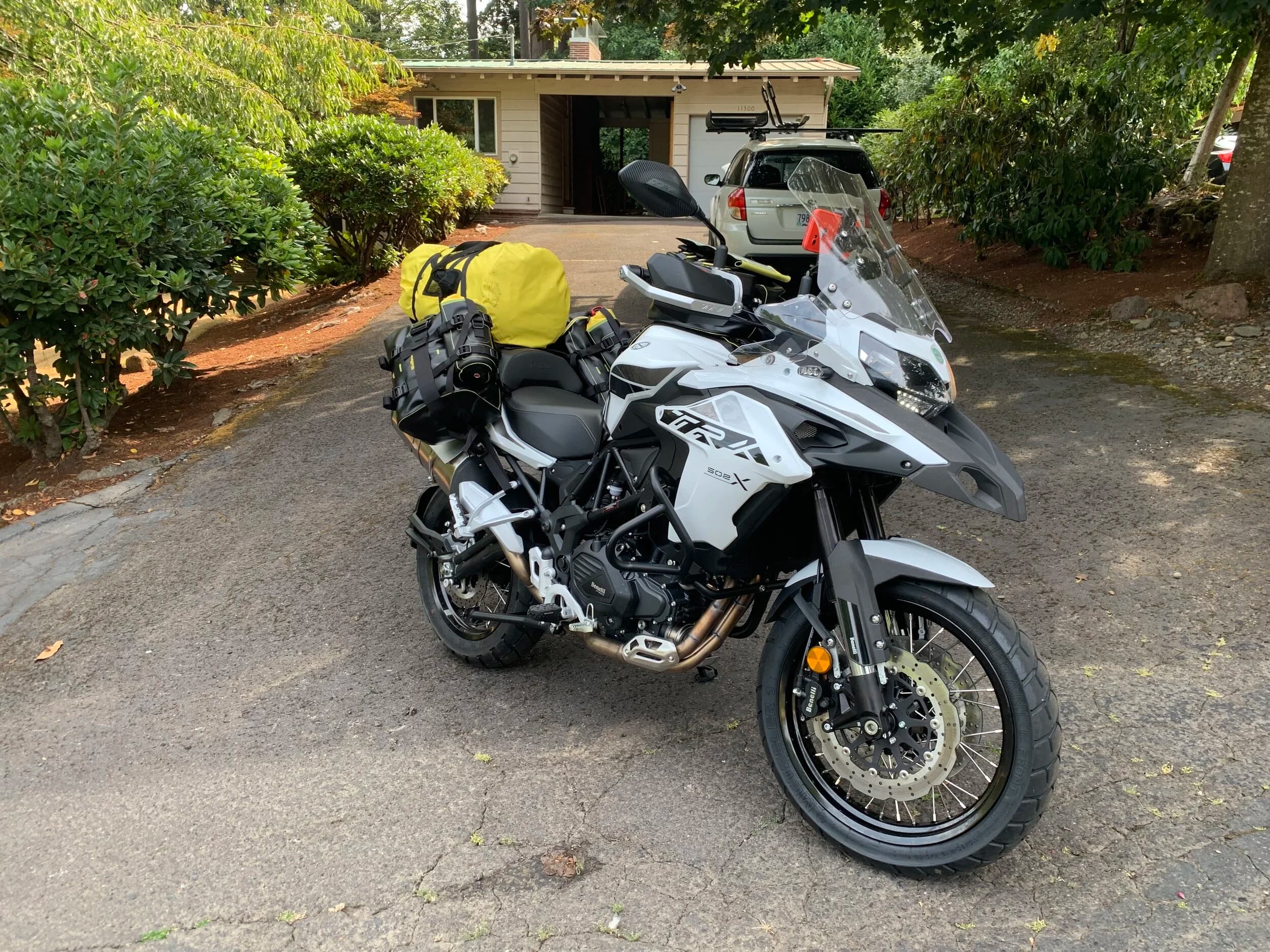 Trip Report: Portland to Olympic Peninsula to Orcas Island
If you follow me on Instagram, you know I purchased a 2021 Benelli TRK502X in July. I just completed my first overnight trip with the new Benelli, doing 7 nights / 8 days from Portland, up the Olympic Peninsula, over to Bellingham and then finally to Orcas Island.
The plan was to camp most or all nights until my last two nights on Orcas, where I had a small waterfront cottage rented right in Orcas Village, where the ferry lands. After three nights of camping, however, I realized I can’t really do the “thin air pad on the ground” thing anymore (I’d be 50 in a week, after all!). My back was killing me and I was not sleeping well, making the following day’s ride less enjoyable at best, and probably also less safe.
So, instead of 5 nights of camping, I did three and then found a cheap motel in Port Angeles, figuring I’d camp the next night and then do my two nights in the cottage. As it happened, most of the next day was rain and the forecast was rain all night and into the morning, so I ended up in a hotel in Bellingham to avoid setting up and breaking down camp in the rain. I can do it. Have done it. But if money is no object and there is lodging available, why be miserable?
The route I planned was intended to get me familiar with the TRK’s manners while allowing for the fact that I’d be riding solo and really didn’t want to get into trouble that I couldn’t get myself out of. The 502X, despite being a 500cc bike, is not light. Curb weight is listed as 518 lbs (dry is 470). So, I favored two lane highways, but included some backcountry single lane roads that were a mix of pavement and gravel.
Here’s my trip report. Day 1Planned / Actual Destination: Cape Disappointment State Park
Planned / Actual Accommodation: Camping
Planned / Actual Miles: 201 / 212
Planned Route: Tigard to Seaside via the Nestucca River Backcountry Byway; Seaside to Cape Disappointment via US 101.
Route NotesI let Google guide me to Carlton from Tigard (home base). On Gaia GPS, I had planned a route that followed the Nestucca River Backcountry Byway from Carlton to Beaver. Unfortunately, there was a detour after McGuire Reservoir (the body of water at the left edge of the right third of the map above) that took me well south down to Bell Mountain along Bald Mountain Rd before heading back north again and rejoining the Nestucca River Rd near Thune Mouintain. Basically, I missed at least half of the scenic route I was hoping for. I wasn’t sure how far the closure went on Nestucca River Rd, and I was still getting the hang of using Gaia to both see where I was, and plan where I wanted to go…so I just followed the signs for the detour. The detour was nice, but it wasn’t the Nestucca River . Most of the route was paved single lane forest road, with a small section of gravel thrown in before the detour.
Once to Beaver, I just rode south on 101 until I saw the signs for Pacific City. Lunch at Pelican Brewery. (I’m not a fan of their new orange grate picnic table outdoor seating.)
After lunch, I rode straight up 101 through Astoria and across to Ilwaco, where I had a reservation to camp at Cape Disappointment. Great spot, right up against the beach (with some trees and brush to break the wind). Camp NotesCape Disappointment was filled mostly with campers pulled by pickup trucks, and my site was nestled between two of them. Most people were friendly. The guy on the north side came over right away to ask about the bike. He’d never seen or heard of Benelli. The guy on the south side came over several times. It’s like he kept looking for excuses to come over and talk more. He even offered me dinner (red beans and rice, with sausage). I accepted. The next morning, he came over with pictures of places I should see in Olympic National Park. The wife of the guy on the north side came over just before I departed for the day’s travels. “Looks like a lot of fun. Nice bike. Reminds me of when we used to backpack. Now we have this thing,” (she gestured to her trailer).
The site itself was great. It was wooded, and sheltered from the beach winds with a thin band of trees and brush, plus a wall of driftwood you had to navigate through and over to get to the beach. The beach itself was gorgeous. Gear NotesI’d read that my trusty MSR Whisperlite Internationale (purchased in 1991) can run on unleaded gasoline just as easily as white gas. Since this kind of moto touring is about going as light and simply as possible, I figured I’d just run unleaded gas instead of bringing white gas. This way, I’d have 1.5 liters of spare gas plus whatever was in my stove bottle in the event that I ran out of gas on the road. Seemed like a great idea.
The reality, as I found out, is that gasoline burns very dirty compared to white gas. It lit, no problem, but the stove was left covered in black soot after a single burn and everything ends up smelling like gasoline. I never realized how much I’d want to smell white gas. So, next trip I’ll ditch the gasoline and go back to white gas.
Also, I threw out my deodorant and body soap before bed. Because I’m using soft bags (not hard aluminum cases) all of my food, toothpaste, and other smelly items need to fit into a small bear canister that fits inside one of my soft bags (keeps rodents out, even if there are no bears). To save space, the stove needs to fit in the bear canister, too. The deodorant and soap simply didn’t fit. So, off they went. Besides, I use Dr. Bronner’s as my dish soap. If I found a shower, I could use that.
Day 2Planned / Actual Destination: South Beach Campground
Planned / Actual Accommodation: Camping
Planned / Actual Miles: 231 / 219
Planned Route: Cape Disappointment up around the Long Beach Peninsula, to South Beach Campground via Raymond, Grayland, Aberdeen, Moclips, Lake Quinault (I skipped the loop around the Long Beach Peninsula)Route NotesToday was a very nice ride. Two lane highway all the way, with a good chunk of it along the coast. I had planned to do a loop up the Long Beach Peninsula, but decided to skip it to save time after spending some time in the morning exploring Cape Disappointment State Park. My destination, South Beach Campground, is first come / first serve and I wasn’t sure how busy it would be, so I didn’t want to arrive too late.
Finding lunch turned out to be a problem. I was avoiding sketchy looking places because the mask wearing seemed to be a problem. I wasn’t looking for conflict. Along the way I discovered the town of Seabrook, which appears to be a vacation shopping mall built specifically to separate you both from reality and your money. Not my kind of place, though I did look to see if there was a place I could eat. Everything looked too fancy for me to roll up in my full moto suit and boots. Where’s a good taco truck when you need one?
I ended up eating in a gas station convenience store (You and I Market) parking lot in Pacific Beach, just up the road from Seabrook with a bunch of day laborers picking up their afternoon tallboys. Gear NotesFor day two, I used Gaia GPS’s route planning feature to set my path to South Beach. It’s quite easy once you figure out the combination of gestures and long-presses (I needed a YouTube video). One caveat is that you either need a data connection (Wi-Fi or mobile data) to be able to do it (if you want the route to snap to a road or trail, which is quite handy), or you need to have downloaded all the map areas and route planning data ahead of time. Ordinarily, this wouldn’t be a problem, but I had brought along two phones: my iPhone (which is my regular phone) for pictures and communication (it would ride in my chest pocket); and Goggle Pixel 3 I’d purchased to use only for navigation (it would be mounted to the handlebars). I don’t have data for the Pixel.
This turned out to be a problem because I hadn’t downloaded all the map areas and route planning data for my trip onto the Pixel (whereas I had downloaded it all to the iPhone). So, I switched to navigating (still with Gaia GPS) on my iPhone and taking pictures with the Pixel for this leg of the trip, hoping I’d get good Wi-Fi at some point which would allow me to download the data I needed onto the Pixel so I could switch back.
This single day of using the iPhone as my navigation device fried the camera. Two days later, Apple published this.
I still really like having two phones on a trip. (I also have a Spot X satellite communicator for off-grid communication.) It’s nice to have one in the pocket that can come out for a quick picture. It’s also nice to have an emergency backup. It would be nice to have a data plan for the nav phone. Short of that, I just need to be better about downloading map areas and routing data ahead of time (and not using my iPhone for nav). Camp NotesSouth Beach Campground is right on the water, and it’s first-come, first-served. The weather was good, and I felt lucky to get a spot. There were several spots available as it turned out. As I was riding around trying to choose which spot to take, there was a couple with a pickup camper waving me in next to them. This was a first. “We ride!” they exclaimed. So that’s where I set up camp.
The guy’s name was Steve Miller. He sells CBD products online. Seems on brand. They were an amazingly friendly couple, actually. Both ride BMW’s and Steve, especially, was really curious and enthusiastic about the TRK. The bike was really turning out to be a conversation starter. He came over several different times while I was setting up camp and making dinner to ask questions or share info about riding groups he’s a part of. It was really quite welcome.
In the morning they gifted me some carrot zucchini bread for breakfast and then broke camp and pulled out well before I did.