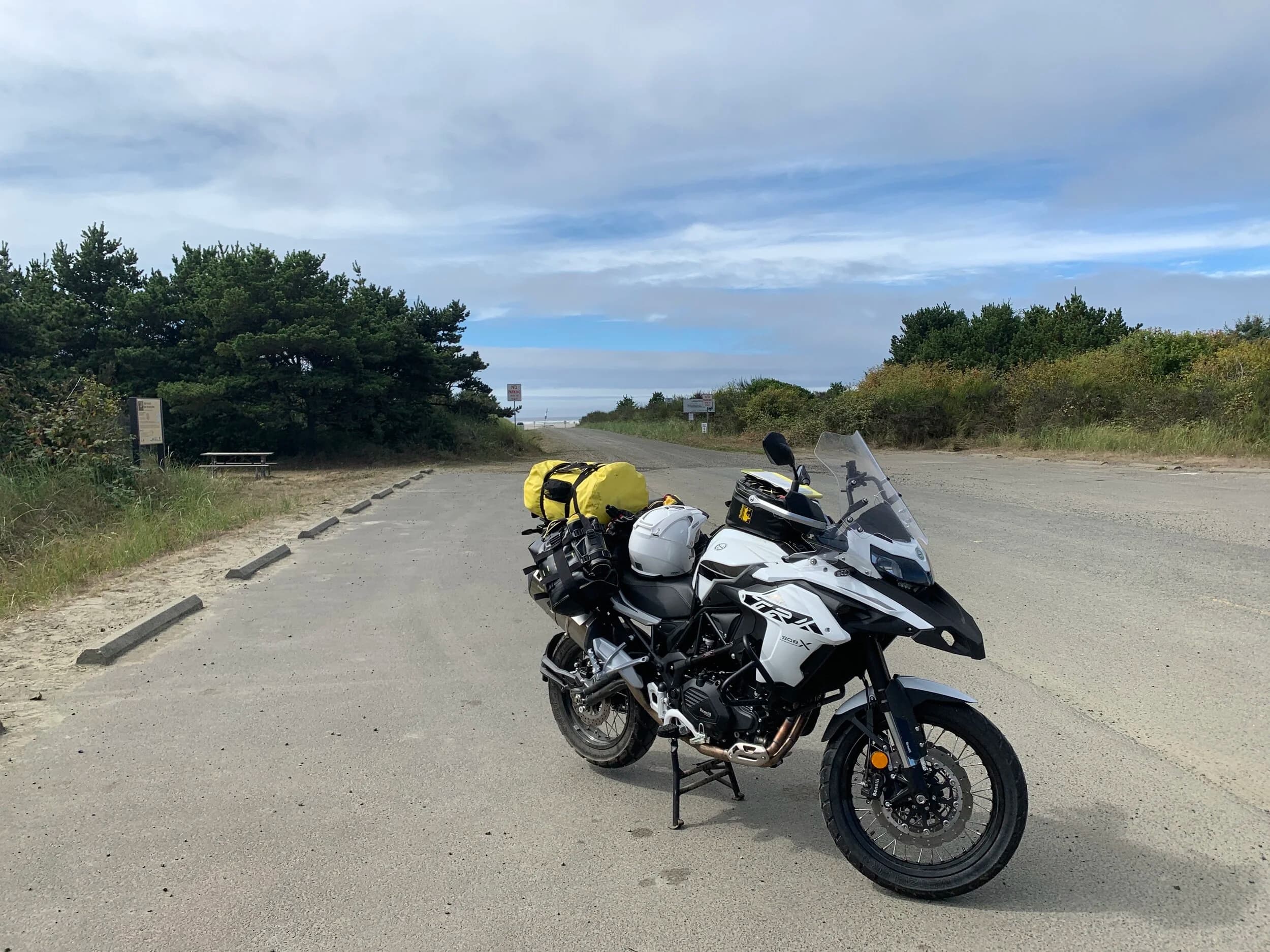 Trip Report: Portland to Olympic Peninsula to Orcas Island
If you follow me on Instagram, you know I purchased a 2021 Benelli TRK502X in July. I just completed my first overnight trip with the new Benelli, doing 7 nights / 8 days from Portland, up the Olympic Peninsula, over to Bellingham and then finally to Orcas Island.
The plan was to camp most or all nights until my last two nights on Orcas, where I had a small waterfront cottage rented right in Orcas Village, where the ferry lands. After three nights of camping, however, I realized I can’t really do the “thin air pad on the ground” thing anymore (I’d be 50 in a week, after all!). My back was killing me and I was not sleeping well, making the following day’s ride less enjoyable at best, and probably also less safe.
So, instead of 5 nights of camping, I did three and then found a cheap motel in Port Angeles, figuring I’d camp the next night and then do my two nights in the cottage. As it happened, most of the next day was rain and the forecast was rain all night and into the morning, so I ended up in a hotel in Bellingham to avoid setting up and breaking down camp in the rain. I can do it. Have done it. But if money is no object and there is lodging available, why be miserable?
The route I planned was intended to get me familiar with the TRK’s manners while allowing for the fact that I’d be riding solo and really didn’t want to get into trouble that I couldn’t get myself out of. The 502X, despite being a 500cc bike, is not light. Curb weight is listed as 518 lbs (dry is 470). So, I favored two lane highways, but included some backcountry single lane roads that were a mix of pavement and gravel.
Here’s my trip report. Day 1Planned / Actual Destination: Cape Disappointment State Park
Planned / Actual Accommodation: Camping
Planned / Actual Miles: 201 / 212
Planned Route: Tigard to Seaside via the Nestucca River Backcountry Byway; Seaside to Cape Disappointment via US 101.
Route NotesI let Google guide me to Carlton from Tigard (home base). On Gaia GPS, I had planned a route that followed the Nestucca River Backcountry Byway from Carlton to Beaver. Unfortunately, there was a detour after McGuire Reservoir (the body of water at the left edge of the right third of the map above) that took me well south down to Bell Mountain along Bald Mountain Rd before heading back north again and rejoining the Nestucca River Rd near Thune Mouintain. Basically, I missed at least half of the scenic route I was hoping for. I wasn’t sure how far the closure went on Nestucca River Rd, and I was still getting the hang of using Gaia to both see where I was, and plan where I wanted to go…so I just followed the signs for the detour. The detour was nice, but it wasn’t the Nestucca River . Most of the route was paved single lane forest road, with a small section of gravel thrown in before the detour.
Once to Beaver, I just rode south on 101 until I saw the signs for Pacific City. Lunch at Pelican Brewery. (I’m not a fan of their new orange grate picnic table outdoor seating.)
After lunch, I rode straight up 101 through Astoria and across to Ilwaco, where I had a reservation to camp at Cape Disappointment. Great spot, right up against the beach (with some trees and brush to break the wind). Camp NotesCape Disappointment was filled mostly with campers pulled by pickup trucks, and my site was nestled between two of them. Most people were friendly. The guy on the north side came over right away to ask about the bike. He’d never seen or heard of Benelli. The guy on the south side came over several times. It’s like he kept looking for excuses to come over and talk more. He even offered me dinner (red beans and rice, with sausage). I accepted. The next morning, he came over with pictures of places I should see in Olympic National Park. The wife of the guy on the north side came over just before I departed for the day’s travels. “Looks like a lot of fun. Nice bike. Reminds me of when we used to backpack. Now we have this thing,” (she gestured to her trailer).
The site itself was great. It was wooded, and sheltered from the beach winds with a thin band of trees and brush, plus a wall of driftwood you had to navigate through and over to get to the beach. The beach itself was gorgeous. Gear NotesI’d read that my trusty MSR Whisperlite Internationale (purchased in 1991) can run on unleaded gasoline just as easily as white gas. Since this kind of moto touring is about going as light and simply as possible, I figured I’d just run unleaded gas instead of bringing white gas. This way, I’d have 1.5 liters of spare gas plus whatever was in my stove bottle in the event that I ran out of gas on the road. Seemed like a great idea.
The reality, as I found out, is that gasoline burns very dirty compared to white gas. It lit, no problem, but the stove was left covered in black soot after a single burn and everything ends up smelling like gasoline. I never realized how much I’d want to smell white gas. So, next trip I’ll ditch the gasoline and go back to white gas.
Also, I threw out my deodorant and body soap before bed. Because I’m using soft bags (not hard aluminum cases) all of my food, toothpaste, and other smelly items need to fit into a small bear canister that fits inside one of my soft bags (keeps rodents out, even if there are no bears). To save space, the stove needs to fit in the bear canister, too. The deodorant and soap simply didn’t fit. So, off they went. Besides, I use Dr. Bronner’s as my dish soap. If I found a shower, I could use that.
Day 2Planned / Actual Destination: South Beach Campground
Planned / Actual Accommodation: Camping
Planned / Actual Miles: 231 / 219
Planned Route: Cape Disappointment up around the Long Beach Peninsula, to South Beach Campground via Raymond, Grayland, Aberdeen, Moclips, Lake Quinault (I skipped the loop around the Long Beach Peninsula)Route NotesToday was a very nice ride. Two lane highway all the way, with a good chunk of it along the coast. I had planned to do a loop up the Long Beach Peninsula, but decided to skip it to save time after spending some time in the morning exploring Cape Disappointment State Park. My destination, South Beach Campground, is first come / first serve and I wasn’t sure how busy it would be, so I didn’t want to arrive too late.
Finding lunch turned out to be a problem. I was avoiding sketchy looking places because the mask wearing seemed to be a problem. I wasn’t looking for conflict. Along the way I discovered the town of Seabrook, which appears to be a vacation shopping mall built specifically to separate you both from reality and your money. Not my kind of place, though I did look to see if there was a place I could eat. Everything looked too fancy for me to roll up in my full moto suit and boots. Where’s a good taco truck when you need one?
I ended up eating in a gas station convenience store (You and I Market) parking lot in Pacific Beach, just up the road from Seabrook with a bunch of day laborers picking up their afternoon tallboys. Gear NotesFor day two, I used Gaia GPS’s route planning feature to set my path to South Beach. It’s quite easy once you figure out the combination of gestures and long-presses (I needed a YouTube video). One caveat is that you either need a data connection (Wi-Fi or mobile data) to be able to do it (if you want the route to snap to a road or trail, which is quite handy), or you need to have downloaded all the map areas and route planning data ahead of time. Ordinarily, this wouldn’t be a problem, but I had brought along two phones: my iPhone (which is my regular phone) for pictures and communication (it would ride in my chest pocket); and Goggle Pixel 3 I’d purchased to use only for navigation (it would be mounted to the handlebars). I don’t have data for the Pixel.
This turned out to be a problem because I hadn’t downloaded all the map areas and route planning data for my trip onto the Pixel (whereas I had downloaded it all to the iPhone). So, I switched to navigating (still with Gaia GPS) on my iPhone and taking pictures with the Pixel for this leg of the trip, hoping I’d get good Wi-Fi at some point which would allow me to download the data I needed onto the Pixel so I could switch back.
This single day of using the iPhone as my navigation device fried the camera. Two days later, Apple published this.
I still really like having two phones on a trip. (I also have a Spot X satellite communicator for off-grid communication.) It’s nice to have one in the pocket that can come out for a quick picture. It’s also nice to have an emergency backup. It would be nice to have a data plan for the nav phone. Short of that, I just need to be better about downloading map areas and routing data ahead of time (and not using my iPhone for nav). Camp NotesSouth Beach Campground is right on the water, and it’s first-come, first-served. The weather was good, and I felt lucky to get a spot. There were several spots available as it turned out. As I was riding around trying to choose which spot to take, there was a couple with a pickup camper waving me in next to them. This was a first. “We ride!” they exclaimed. So that’s where I set up camp.
The guy’s name was Steve Miller. He sells CBD products online. Seems on brand. They were an amazingly friendly couple, actually. Both ride BMW’s and Steve, especially, was really curious and enthusiastic about the TRK. The bike was really turning out to be a conversation starter. He came over several different times while I was setting up camp and making dinner to ask questions or share info about riding groups he’s a part of. It was really quite welcome.
In the morning they gifted me some carrot zucchini bread for breakfast and then broke camp and pulled out well before I did.