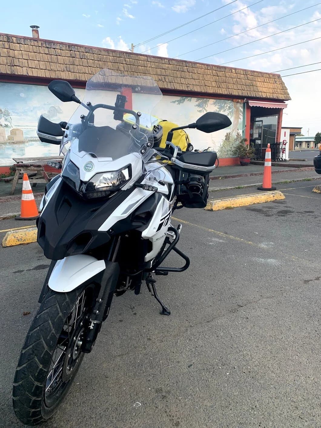 Trip Report: Portland to Olympic Peninsula to Orcas Island
If you follow me on Instagram, you know I purchased a 2021 Benelli TRK502X in July. I just completed my first overnight trip with the new Benelli, doing 7 nights / 8 days from Portland, up the Olympic Peninsula, over to Bellingham and then finally to Orcas Island.
The plan was to camp most or all nights until my last two nights on Orcas, where I had a small waterfront cottage rented right in Orcas Village, where the ferry lands. After three nights of camping, however, I realized I can’t really do the “thin air pad on the ground” thing anymore (I’d be 50 in a week, after all!). My back was killing me and I was not sleeping well, making the following day’s ride less enjoyable at best, and probably also less safe.
So, instead of 5 nights of camping, I did three and then found a cheap motel in Port Angeles, figuring I’d camp the next night and then do my two nights in the cottage. As it happened, most of the next day was rain and the forecast was rain all night and into the morning, so I ended up in a hotel in Bellingham to avoid setting up and breaking down camp in the rain. I can do it. Have done it. But if money is no object and there is lodging available, why be miserable?
The route I planned was intended to get me familiar with the TRK’s manners while allowing for the fact that I’d be riding solo and really didn’t want to get into trouble that I couldn’t get myself out of. The 502X, despite being a 500cc bike, is not light. Curb weight is listed as 518 lbs (dry is 470). So, I favored two lane highways, but included some backcountry single lane roads that were a mix of pavement and gravel.
Here’s my trip report. Day 1Planned / Actual Destination: Cape Disappointment State Park
Planned / Actual Accommodation: Camping
Planned / Actual Miles: 201 / 212
Planned Route: Tigard to Seaside via the Nestucca River Backcountry Byway; Seaside to Cape Disappointment via US 101.
Route NotesI let Google guide me to Carlton from Tigard (home base). On Gaia GPS, I had planned a route that followed the Nestucca River Backcountry Byway from Carlton to Beaver. Unfortunately, there was a detour after McGuire Reservoir (the body of water at the left edge of the right third of the map above) that took me well south down to Bell Mountain along Bald Mountain Rd before heading back north again and rejoining the Nestucca River Rd near Thune Mouintain. Basically, I missed at least half of the scenic route I was hoping for. I wasn’t sure how far the closure went on Nestucca River Rd, and I was still getting the hang of using Gaia to both see where I was, and plan where I wanted to go…so I just followed the signs for the detour. The detour was nice, but it wasn’t the Nestucca River . Most of the route was paved single lane forest road, with a small section of gravel thrown in before the detour.
Once to Beaver, I just rode south on 101 until I saw the signs for Pacific City. Lunch at Pelican Brewery. (I’m not a fan of their new orange grate picnic table outdoor seating.)
After lunch, I rode straight up 101 through Astoria and across to Ilwaco, where I had a reservation to camp at Cape Disappointment. Great spot, right up against the beach (with some trees and brush to break the wind). Camp NotesCape Disappointment was filled mostly with campers pulled by pickup trucks, and my site was nestled between two of them. Most people were friendly. The guy on the north side came over right away to ask about the bike. He’d never seen or heard of Benelli. The guy on the south side came over several times. It’s like he kept looking for excuses to come over and talk more. He even offered me dinner (red beans and rice, with sausage). I accepted. The next morning, he came over with pictures of places I should see in Olympic National Park. The wife of the guy on the north side came over just before I departed for the day’s travels. “Looks like a lot of fun. Nice bike. Reminds me of when we used to backpack. Now we have this thing,” (she gestured to her trailer).
The site itself was great. It was wooded, and sheltered from the beach winds with a thin band of trees and brush, plus a wall of driftwood you had to navigate through and over to get to the beach. The beach itself was gorgeous. Gear NotesI’d read that my trusty MSR Whisperlite Internationale (purchased in 1991) can run on unleaded gasoline just as easily as white gas. Since this kind of moto touring is about going as light and simply as possible, I figured I’d just run unleaded gas instead of bringing white gas. This way, I’d have 1.5 liters of spare gas plus whatever was in my stove bottle in the event that I ran out of gas on the road. Seemed like a great idea.
The reality, as I found out, is that gasoline burns very dirty compared to white gas. It lit, no problem, but the stove was left covered in black soot after a single burn and everything ends up smelling like gasoline. I never realized how much I’d want to smell white gas. So, next trip I’ll ditch the gasoline and go back to white gas.
Also, I threw out my deodorant and body soap before bed. Because I’m using soft bags (not hard aluminum cases) all of my food, toothpaste, and other smelly items need to fit into a small bear canister that fits inside one of my soft bags (keeps rodents out, even if there are no bears). To save space, the stove needs to fit in the bear canister, too. The deodorant and soap simply didn’t fit. So, off they went. Besides, I use Dr. Bronner’s as my dish soap. If I found a shower, I could use that.
Day 2Planned / Actual Destination: South Beach Campground
Planned / Actual Accommodation: Camping
Planned / Actual Miles: 231 / 219
Planned Route: Cape Disappointment up around the Long Beach Peninsula, to South Beach Campground via Raymond, Grayland, Aberdeen, Moclips, Lake Quinault (I skipped the loop around the Long Beach Peninsula)Route NotesToday was a very nice ride. Two lane highway all the way, with a good chunk of it along the coast. I had planned to do a loop up the Long Beach Peninsula, but decided to skip it to save time after spending some time in the morning exploring Cape Disappointment State Park. My destination, South Beach Campground, is first come / first serve and I wasn’t sure how busy it would be, so I didn’t want to arrive too late.
Finding lunch turned out to be a problem. I was avoiding sketchy looking places because the mask wearing seemed to be a problem. I wasn’t looking for conflict. Along the way I discovered the town of Seabrook, which appears to be a vacation shopping mall built specifically to separate you both from reality and your money. Not my kind of place, though I did look to see if there was a place I could eat. Everything looked too fancy for me to roll up in my full moto suit and boots. Where’s a good taco truck when you need one?
I ended up eating in a gas station convenience store (You and I Market) parking lot in Pacific Beach, just up the road from Seabrook with a bunch of day laborers picking up their afternoon tallboys. Gear NotesFor day two, I used Gaia GPS’s route planning feature to set my path to South Beach. It’s quite easy once you figure out the combination of gestures and long-presses (I needed a YouTube video). One caveat is that you either need a data connection (Wi-Fi or mobile data) to be able to do it (if you want the route to snap to a road or trail, which is quite handy), or you need to have downloaded all the map areas and route planning data ahead of time. Ordinarily, this wouldn’t be a problem, but I had brought along two phones: my iPhone (which is my regular phone) for pictures and communication (it would ride in my chest pocket); and Goggle Pixel 3 I’d purchased to use only for navigation (it would be mounted to the handlebars). I don’t have data for the Pixel.
This turned out to be a problem because I hadn’t downloaded all the map areas and route planning data for my trip onto the Pixel (whereas I had downloaded it all to the iPhone). So, I switched to navigating (still with Gaia GPS) on my iPhone and taking pictures with the Pixel for this leg of the trip, hoping I’d get good Wi-Fi at some point which would allow me to download the data I needed onto the Pixel so I could switch back.
This single day of using the iPhone as my navigation device fried the camera. Two days later, Apple published this.
I still really like having two phones on a trip. (I also have a Spot X satellite communicator for off-grid communication.) It’s nice to have one in the pocket that can come out for a quick picture. It’s also nice to have an emergency backup. It would be nice to have a data plan for the nav phone. Short of that, I just need to be better about downloading map areas and routing data ahead of time (and not using my iPhone for nav). Camp NotesSouth Beach Campground is right on the water, and it’s first-come, first-served. The weather was good, and I felt lucky to get a spot. There were several spots available as it turned out. As I was riding around trying to choose which spot to take, there was a couple with a pickup camper waving me in next to them. This was a first. “We ride!” they exclaimed. So that’s where I set up camp.
The guy’s name was Steve Miller. He sells CBD products online. Seems on brand. They were an amazingly friendly couple, actually. Both ride BMW’s and Steve, especially, was really curious and enthusiastic about the TRK. The bike was really turning out to be a conversation starter. He came over several different times while I was setting up camp and making dinner to ask questions or share info about riding groups he’s a part of. It was really quite welcome.
In the morning they gifted me some carrot zucchini bread for breakfast and then broke camp and pulled out well before I did.