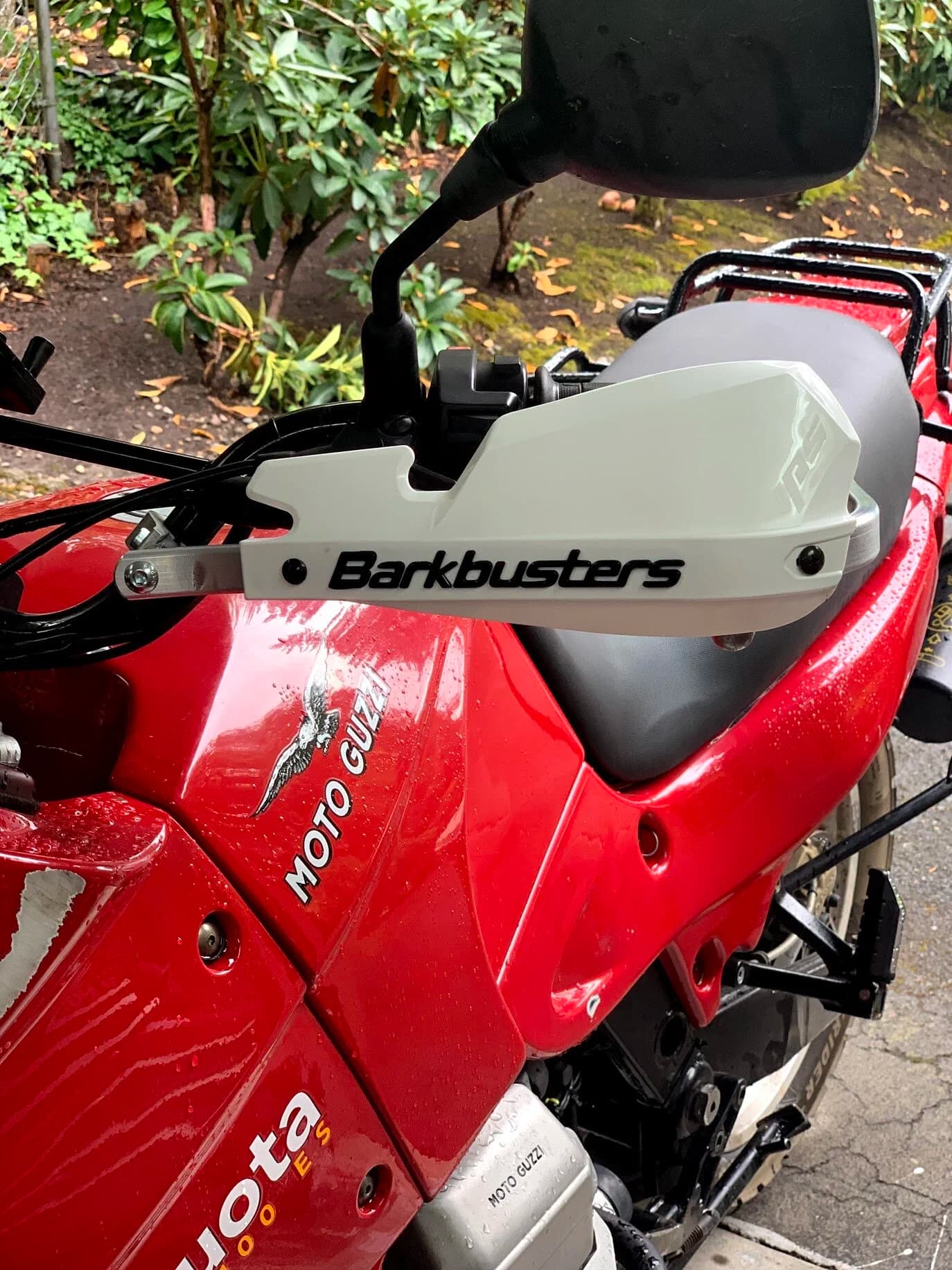 State of the Quota, pt. One
If you’ve read my first post or the About section, you know I’m planning on riding a Moto Guzzi Quota 1100ES on the first several sections of the Nevada BDR (along with my brother on his KLR 650) in spring 2020. There’s a lot of prep to do before then, but let’s start with the State of the Quota.
The bike in question was made in Mandello del Lario, Italy at the historic Moto Guzzi factory. Moto Guzzi, established in 1921, is the oldest European motorcycle works in continuous production. The Quota 1100ES was made from 1998 to 2001 but was only sent to the United States, in very small quantities, for the 1999 and 2000 model years. I can’t find a definitive source, but the consensus seems to be that only about 130 units total were sent to the US. The one I own is model year 2000 and is the only one I’ve ever seen in real life. It’s probably a safe bet that only half of those original US-bound bikes are still on the road. It’s a very small club.
The good news, though, is that, although the frame and body components are entirely unique, the motor and drivetrain are assembled from common Guzzi parts and are easy to come by. That said, it would really be smart to buy a second Quota as a parts donor bike. Some things, like shift levers and body parts, are getting harder to find (and much more expensive). The club is getting smaller.
I acquired my Quota in the spring of 2018 from my buddy Patrick in Seattle who collects, builds and barters all things Moto Guzzi. I’m not sure how or why he had it. He’s not an “adventure” rider. I think he just thought it was cool. Which it is.
The bike needed a bit of work when I bought it and part of the deal was that we’d do that work together, in his garage, before I trailered it back home to Portland. So, over the course of a weekend, we replaced a head that had a stripped out exhaust stud with a spare Patrick had laying around (see note above about collecting and bartering), swapped out the middle muffler for straight-through Y-pipe, changed the fluids, and adjusted the valves.
Sounds all very simple, but there was a hiccup. After installing the replacement head and moving on to reassembly and connection of the accessory components we discovered that there was no place in the new head for the head temp sensor, which is used by the electronic fuel injection (EFI) system. In the original head, there’s a threaded bore into which the threaded end of the brass sensor unit is screwed. No such bore on the donor head.
After some calling around to Patrick’s Moto Guzzi mechanic friends, it was decided that the brass heat sink of the temp sensor simply needs to be in contact with the head somewhere and that would provide enough thermal transfer to give the EFI the engine temp info it needs to adjust fuel delivery properly. So, Patrick drilled some small holes into the cooling fins on the inboard side of the head and lashed the temp sensor assembly to the head sideways, brass to aluminum. It seems to work. It’s been working for two years. All the same it’s not like me to jury-rig something like this, and it bugs me constantly. Even more so now that I’ve admitted my mechanical transgression publicly.
You’ll note in a later post that I have stainless safety wire on my packing list…and you’ll know why.
With that out of the way, here’s a catalog of what’s been done to date and the current state of the Quota. Mods & Repairs To Date Electrical Battery (upgraded to Odyssey AGM) Stator (replaced failing unit)Regulator / Rectifier (retrofit a Drag Specialties Harley Davidson part less finicky about AGM batteries) Headlight (retrofit an MZ Skorpion head - the original is dangerously anemic) Riding / “see me” lights (added)Voltage meter (added to dash) Mechanical Right-side head (replaced with donor)Head temp sensor (bastardized, see above) Middle muffler (replaced with Mistral Y-pipe)Front crank seal (replaced) Exhaust crossover removed, headers wrapped (done by previous owner, these always crack) Running Gear Rear wheel rim (replaced with Sun Rims wheel from a wrecked Quota, found on eBay; the original Excel rears are crack-prone)Tires (Avon Trekriders 50/50 adventure sport)Pinned shift actuator lever to shaft (it kept falling off while I was riding!)AccessoriesUSB charge portPhone mount (Perfect Squeeze from Hondo Garage)Tool tube (from Agri Supply)Barkbusters Heated grips (added by previous owner)
The bike also has OEM Hepco+Becker Moto Guzzi hard bags which, in my opinion, are really made for road travel. I’m considering whether to use them on Nevada BDR trip. Leaning toward no; the mounting hardware makes a good platform for soft luggage, though.
Next post we’ll look at the to-do and wish lists heading into Nevada.