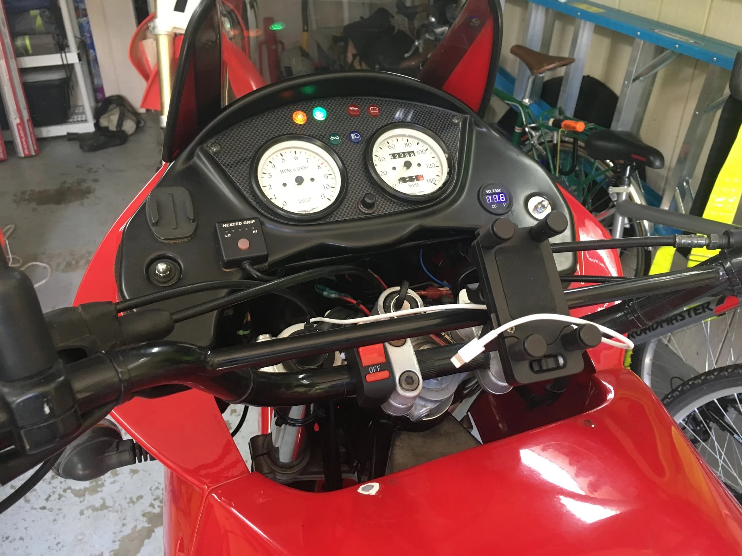 State of the Quota, pt. One
If you’ve read my first post or the About section, you know I’m planning on riding a Moto Guzzi Quota 1100ES on the first several sections of the Nevada BDR (along with my brother on his KLR 650) in spring 2020. There’s a lot of prep to do before then, but let’s start with the State of the Quota.
The bike in question was made in Mandello del Lario, Italy at the historic Moto Guzzi factory. Moto Guzzi, established in 1921, is the oldest European motorcycle works in continuous production. The Quota 1100ES was made from 1998 to 2001 but was only sent to the United States, in very small quantities, for the 1999 and 2000 model years. I can’t find a definitive source, but the consensus seems to be that only about 130 units total were sent to the US. The one I own is model year 2000 and is the only one I’ve ever seen in real life. It’s probably a safe bet that only half of those original US-bound bikes are still on the road. It’s a very small club.
The good news, though, is that, although the frame and body components are entirely unique, the motor and drivetrain are assembled from common Guzzi parts and are easy to come by. That said, it would really be smart to buy a second Quota as a parts donor bike. Some things, like shift levers and body parts, are getting harder to find (and much more expensive). The club is getting smaller.
I acquired my Quota in the spring of 2018 from my buddy Patrick in Seattle who collects, builds and barters all things Moto Guzzi. I’m not sure how or why he had it. He’s not an “adventure” rider. I think he just thought it was cool. Which it is.
The bike needed a bit of work when I bought it and part of the deal was that we’d do that work together, in his garage, before I trailered it back home to Portland. So, over the course of a weekend, we replaced a head that had a stripped out exhaust stud with a spare Patrick had laying around (see note above about collecting and bartering), swapped out the middle muffler for straight-through Y-pipe, changed the fluids, and adjusted the valves.
Sounds all very simple, but there was a hiccup. After installing the replacement head and moving on to reassembly and connection of the accessory components we discovered that there was no place in the new head for the head temp sensor, which is used by the electronic fuel injection (EFI) system. In the original head, there’s a threaded bore into which the threaded end of the brass sensor unit is screwed. No such bore on the donor head.
After some calling around to Patrick’s Moto Guzzi mechanic friends, it was decided that the brass heat sink of the temp sensor simply needs to be in contact with the head somewhere and that would provide enough thermal transfer to give the EFI the engine temp info it needs to adjust fuel delivery properly. So, Patrick drilled some small holes into the cooling fins on the inboard side of the head and lashed the temp sensor assembly to the head sideways, brass to aluminum. It seems to work. It’s been working for two years. All the same it’s not like me to jury-rig something like this, and it bugs me constantly. Even more so now that I’ve admitted my mechanical transgression publicly.
You’ll note in a later post that I have stainless safety wire on my packing list…and you’ll know why.
With that out of the way, here’s a catalog of what’s been done to date and the current state of the Quota. Mods & Repairs To Date Electrical Battery (upgraded to Odyssey AGM) Stator (replaced failing unit)Regulator / Rectifier (retrofit a Drag Specialties Harley Davidson part less finicky about AGM batteries) Headlight (retrofit an MZ Skorpion head - the original is dangerously anemic) Riding / “see me” lights (added)Voltage meter (added to dash) Mechanical Right-side head (replaced with donor)Head temp sensor (bastardized, see above) Middle muffler (replaced with Mistral Y-pipe)Front crank seal (replaced) Exhaust crossover removed, headers wrapped (done by previous owner, these always crack) Running Gear Rear wheel rim (replaced with Sun Rims wheel from a wrecked Quota, found on eBay; the original Excel rears are crack-prone)Tires (Avon Trekriders 50/50 adventure sport)Pinned shift actuator lever to shaft (it kept falling off while I was riding!)AccessoriesUSB charge portPhone mount (Perfect Squeeze from Hondo Garage)Tool tube (from Agri Supply)Barkbusters Heated grips (added by previous owner)
The bike also has OEM Hepco+Becker Moto Guzzi hard bags which, in my opinion, are really made for road travel. I’m considering whether to use them on Nevada BDR trip. Leaning toward no; the mounting hardware makes a good platform for soft luggage, though.
Next post we’ll look at the to-do and wish lists heading into Nevada.
