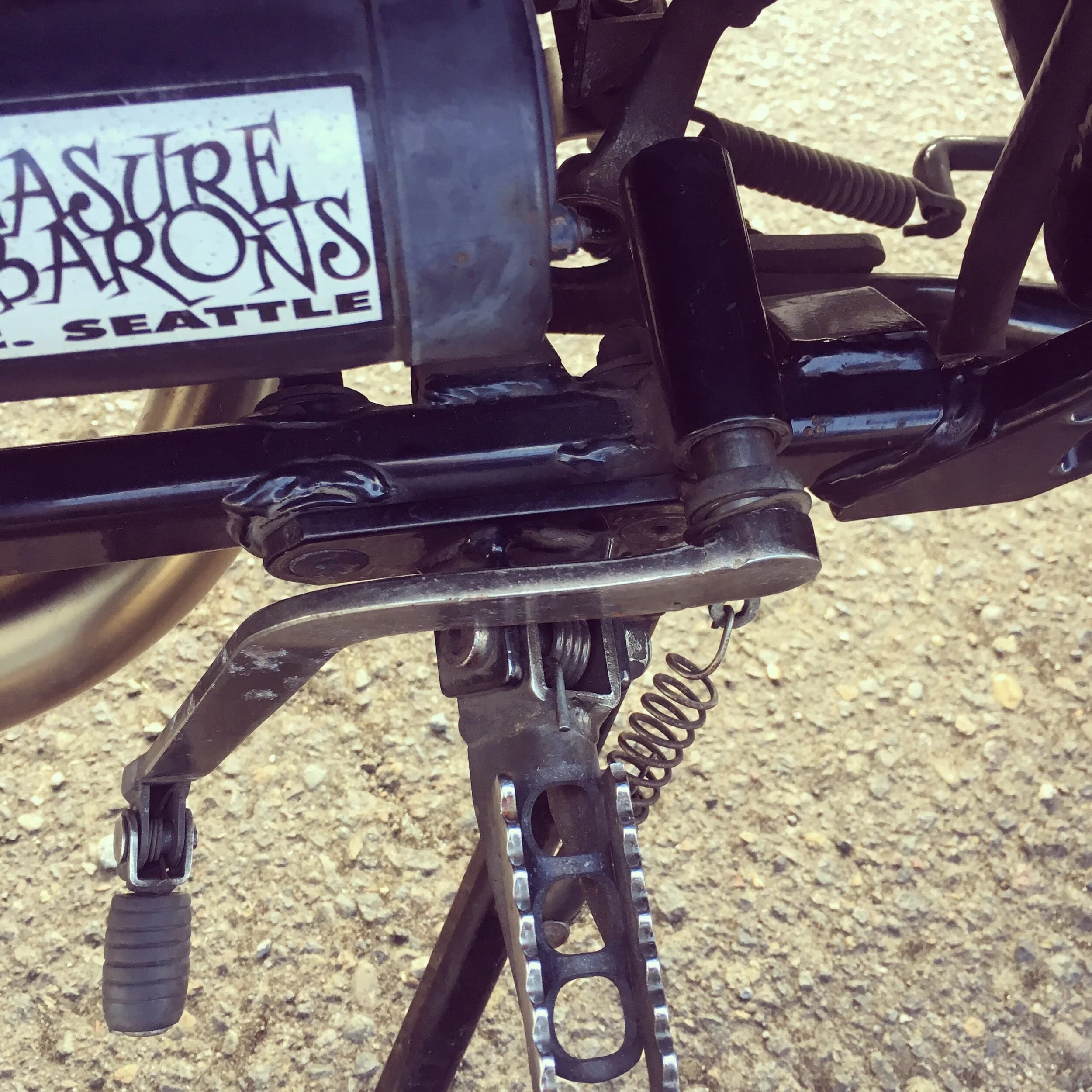 State of the Quota, pt. One
If you’ve read my first post or the About section, you know I’m planning on riding a Moto Guzzi Quota 1100ES on the first several sections of the Nevada BDR (along with my brother on his KLR 650) in spring 2020. There’s a lot of prep to do before then, but let’s start with the State of the Quota.
The bike in question was made in Mandello del Lario, Italy at the historic Moto Guzzi factory. Moto Guzzi, established in 1921, is the oldest European motorcycle works in continuous production. The Quota 1100ES was made from 1998 to 2001 but was only sent to the United States, in very small quantities, for the 1999 and 2000 model years. I can’t find a definitive source, but the consensus seems to be that only about 130 units total were sent to the US. The one I own is model year 2000 and is the only one I’ve ever seen in real life. It’s probably a safe bet that only half of those original US-bound bikes are still on the road. It’s a very small club.
The good news, though, is that, although the frame and body components are entirely unique, the motor and drivetrain are assembled from common Guzzi parts and are easy to come by. That said, it would really be smart to buy a second Quota as a parts donor bike. Some things, like shift levers and body parts, are getting harder to find (and much more expensive). The club is getting smaller.
I acquired my Quota in the spring of 2018 from my buddy Patrick in Seattle who collects, builds and barters all things Moto Guzzi. I’m not sure how or why he had it. He’s not an “adventure” rider. I think he just thought it was cool. Which it is.
The bike needed a bit of work when I bought it and part of the deal was that we’d do that work together, in his garage, before I trailered it back home to Portland. So, over the course of a weekend, we replaced a head that had a stripped out exhaust stud with a spare Patrick had laying around (see note above about collecting and bartering), swapped out the middle muffler for straight-through Y-pipe, changed the fluids, and adjusted the valves.
Sounds all very simple, but there was a hiccup. After installing the replacement head and moving on to reassembly and connection of the accessory components we discovered that there was no place in the new head for the head temp sensor, which is used by the electronic fuel injection (EFI) system. In the original head, there’s a threaded bore into which the threaded end of the brass sensor unit is screwed. No such bore on the donor head.
After some calling around to Patrick’s Moto Guzzi mechanic friends, it was decided that the brass heat sink of the temp sensor simply needs to be in contact with the head somewhere and that would provide enough thermal transfer to give the EFI the engine temp info it needs to adjust fuel delivery properly. So, Patrick drilled some small holes into the cooling fins on the inboard side of the head and lashed the temp sensor assembly to the head sideways, brass to aluminum. It seems to work. It’s been working for two years. All the same it’s not like me to jury-rig something like this, and it bugs me constantly. Even more so now that I’ve admitted my mechanical transgression publicly.
You’ll note in a later post that I have stainless safety wire on my packing list…and you’ll know why.
With that out of the way, here’s a catalog of what’s been done to date and the current state of the Quota. Mods & Repairs To Date Electrical Battery (upgraded to Odyssey AGM) Stator (replaced failing unit)Regulator / Rectifier (retrofit a Drag Specialties Harley Davidson part less finicky about AGM batteries) Headlight (retrofit an MZ Skorpion head - the original is dangerously anemic) Riding / “see me” lights (added)Voltage meter (added to dash) Mechanical Right-side head (replaced with donor)Head temp sensor (bastardized, see above) Middle muffler (replaced with Mistral Y-pipe)Front crank seal (replaced) Exhaust crossover removed, headers wrapped (done by previous owner, these always crack) Running Gear Rear wheel rim (replaced with Sun Rims wheel from a wrecked Quota, found on eBay; the original Excel rears are crack-prone)Tires (Avon Trekriders 50/50 adventure sport)Pinned shift actuator lever to shaft (it kept falling off while I was riding!)AccessoriesUSB charge portPhone mount (Perfect Squeeze from Hondo Garage)Tool tube (from Agri Supply)Barkbusters Heated grips (added by previous owner)
The bike also has OEM Hepco+Becker Moto Guzzi hard bags which, in my opinion, are really made for road travel. I’m considering whether to use them on Nevada BDR trip. Leaning toward no; the mounting hardware makes a good platform for soft luggage, though.
Next post we’ll look at the to-do and wish lists heading into Nevada.