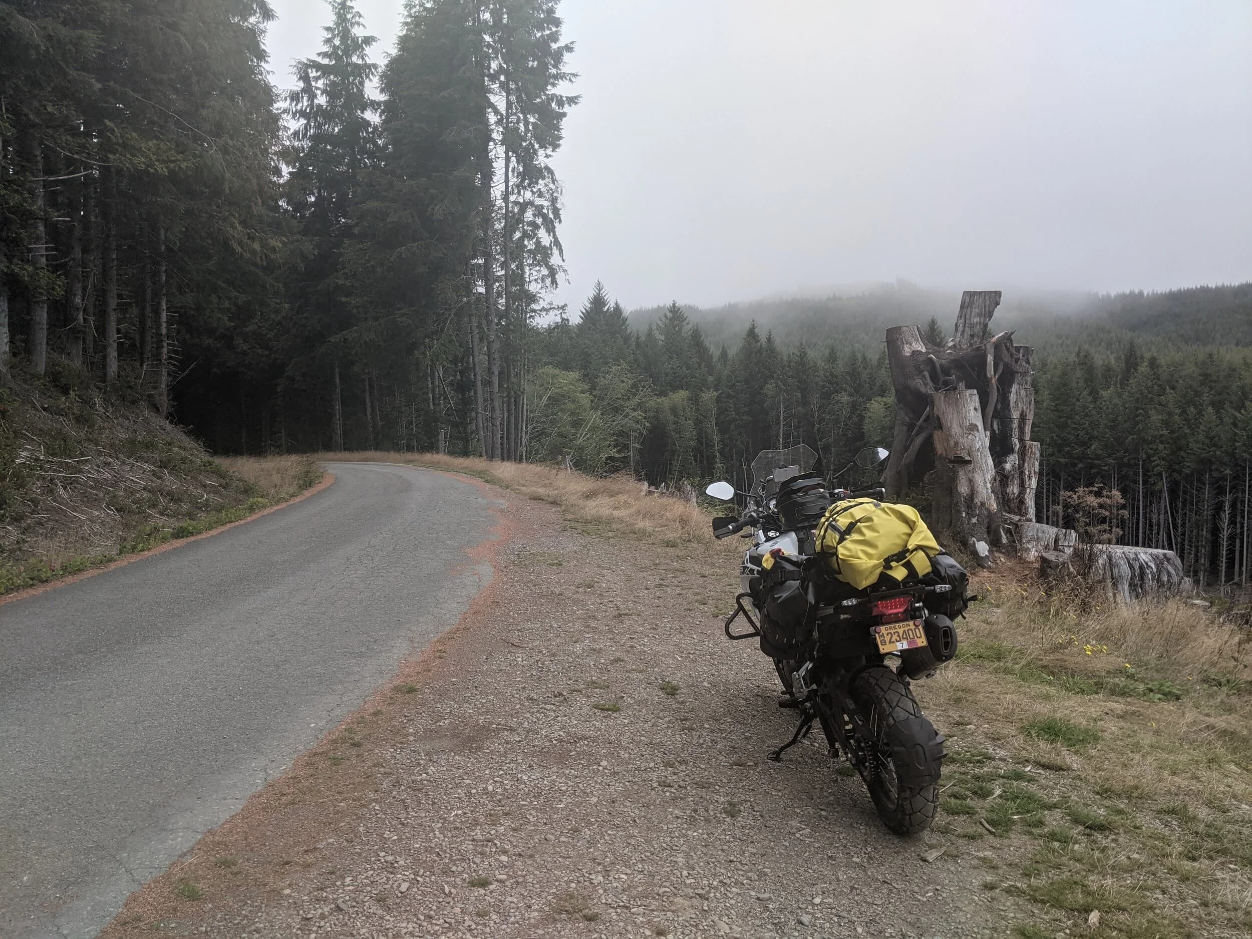 South Beach to Hoh Rainforest
This is the second installment of my trip log of my first overnight trip with the new Benelli TRK502X, doing 7 nights / 8 days from Portland, up the Olympic Peninsula, over to Bellingham and then finally to Orcas Island.
Day 3Planned Destination: Forks or La Push
Actual Destination: Hoh Rainforest Campground
Planned / Actual Accommodation: Camping
Planned / Actual Miles: 100 / 111
Planned Route: Follow the Oly Ride Guide Day Three route published by ADV Pulse, and camp somewhere near Forks or La PushRoute NotesAfter breaking camp I headed south to Queets to get gas and then back up US 101 to the store at Kalaloch to buy a sandwich for lunch for the day and pick up a few beers for the evening. I’d actually had trouble finding a place that was open and that sold beer the night before, so I was going into this day better prepared.
Today’s route was planned to be basically all of the Day 3 section of the ADV Pulse’s Olympic Peninsula route. No specific place planned to camp. I’d just find something when I was done for the day. The day started out well, and I got my first introduction to gravel roads and gravel two track on the TRK. After my experience on the WABDR on the Quota (which I haven’t written about, but I crashed hard; the Quota is in the garage patiently waiting to be rehabbed now), I was taking things slow and easy. The TRK isn’t that much lighter than the Quota, even though it’s half a liter smaller engine-wise, and I’m not sure yet if I can pick it up, so I didn’t want to get too excited and get myself into trouble again. Plus, I’m running the 80/10 Metzler Tourance tires that came on the bike; slow and easy.
I did build some confidence, but I never pushed hard. I thought about this a lot as I was riding actually. I mean, I could have pushed a lot harder. Why wasn’t I? The answer is simple. For me, adventure motorcycling (well, life in general) is about making moments. It’s about stringing together as many great memories as I can while I still can. I’ll remember the great views I “discover” along the way. I’ll remember the interesting people I meet. I’ll remember the trip. But I won’t remember if I pushed hard on any given day or not. I just don’t care about that anymore. Plus, when riding alone, you’re alone if you get into trouble. Better to go easy and get there in one piece.I did run into one issue along the way; the C-2000 road was closed. It appeared that my planned route was closed for the season, which hadn’t been noted in the ride guide. So, I backtracked to the Hoh Mainline Road and rejoined the planned route where Mainline meets Maple Creek Rd. I discovered later, upon closer inspection, that I’d actually missed a turn off of C-2000 (onto a road that isn’t labeled on the map) just before the road closure. Not sure how I rode past that turnoff twice without seeing it. So be it. I have an excuse to go back and do that again. It was all still great riding. Camp NotesIt’s been a while since I camped on the ground on a thin air pad, and it wasn’t really agreeing with me anymore; I hand’t slept well the last two nights. By the time I got to the Hoh Visitor Center I was tired and ready to be done. The Hoh Campground is reservation only, and there were no sites available when I was planning the trip. But, there was a sign at the visitor center beckoning visitors to inquire at the campground desk if there were any camp sites available, so that’s what I did.
I lucked out; there were several sites available. I got a great site with a somewhat secluded tent space (though I worried about tent flooding as it was several feet lower than the surrounding land; fortunately there was no rain). I met a young couple who were actually sleeping in their car. Ouch. They didn’t really know how to camp. She was from Texas but had recently moved to Eugene, Oregon, and he was from England somewhere. She said she was an artist and she’d never done anything like this before. In the morning, she came over and asked if I had a way to heat water so they could have coffee. I obliged.
The guy next to me also came over in the morning and offered me coffee. Motorcycle travel really brings out the friendliness from people in RV trailers. Gear NotesI had noticed a store on the road up to the Hoh visitor center. I rode back to see if they had any food, as I was running low. I hadn’t really been thinking ahead and replenishing food before I needed it, and I was worried that I’d run out. The store had several freeze dried meals, so I picked up something for dinner and some scrambled eggs for breakfast, leaving the food I already had for the next day.
I didn’t have a ton of room for food as I was storing all food (and smelly items) in a small Bare Boxer bear canister from Gossamer Gear. Since I wasn’t running with hard case luggage, I felt I needed a way to keep the rodents (and bears) at bay. The Bare Boxer has room for two days of dinners and breakfasts (freeze dried) plus coffee, some extra oat meal, energy bars, my toothbrush & paste, the dish soap, DEET, and my Whisperlite stove. It worked out quite well the entire trip, actually. Anything that might attract rodents or bears went in the canister, and the canister fit nicely at the bottom of my left-side Wolfman 20L rolie.
As noted above, sleeping on the ground on a thin air pad doesn’t do it for me anymore. My back killed me on the third night, and I did not sleep well at all. I have identified the solution, however. The Helinox Lite Cot. It packs smaller than my air pad and is now on my Christmas wish list. The only downside would be cold weather camping; will need a thin foam pad to provide insulation for temps below freezing, likely.